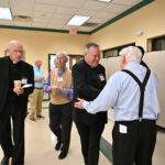 Retired priests pray with the bishop at Parsippany gathering