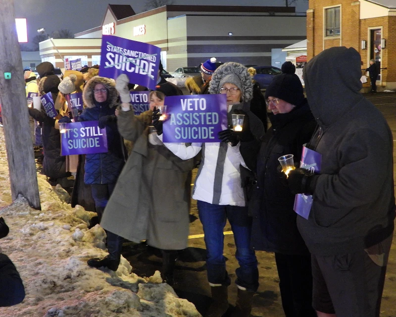 Catholic bishops speak out as New York governor pledges to sign into law assisted suicide – #Catholic –
Disabilities advocates in Buffalo, New York, during a candlelight vigil in opposition to assisted suicide. / Credit: New York Alliance Against Assisted Suicide
CNA Staff, Dec 17, 2025 / 17:00 pm (CNA).
New York Gov. Kathy Hochul will sign into law an assisted suicide bill that Catholic leaders have ardently opposed, making New York the 13th state to allow the practice. Hochul, who called it an “incredibly difficult decision,” said she will sign the bill after lawmakers add some “guardrails.” The bill allows doctors to give terminally ill patients drugs to end their lives. Hochul’s additions to the law include requiring a waiting period, a recorded oral request for death, and a health evaluation. The law will go into effect six months after signing. Cardinal Timothy Dolan of New York and other New York bishops have been outspoken against the legislation, issuing several statements opposing it. In a brief meeting with Hochul over the summer, Dolan urged her not to sign the measure. Earlier this month, Illinois Gov. JB Pritzker signed into law similar assisted suicide legislation. Other jurisdictions that permit assisted suicide include: California, Colorado, Delaware, Hawaii, Maine, New Jersey, New Mexico, Oregon, Vermont, Washington, and the District of Columbia.Hochul, who is a Catholic University of America alumna, said in a Dec. 17 statement that the bill will enable people “to suffer less — to shorten not their lives, but their deaths.”“New York has long been a beacon of freedom, and now it is time we extend that freedom to terminally ill New Yorkers who want the right to die comfortably and on their own terms,” Hochul said. “My mother died of ALS, and I am all too familiar with the pain of seeing someone you love suffer and being powerless to stop it,” she continued. In a joint statement, Dolan and the bishops of New York state said they were “extraordinarily troubled” by Hochul’s announcement. The bishops say the law endangers the vulnerable, calling assisted suicide “a grave moral evil” that “is in direct conflict with Catholic teaching on the sacredness and dignity of all human life.” “This new law signals our government’s abandonment of its most vulnerable citizens, telling people who are sick or disabled that suicide in their case is not only acceptable but is encouraged by our elected leaders,” the Dec. 17 statement said. The Patients’ Rights Action Fund, a nonpartisan group that opposes assisted suicide on the grounds that it is inherentaly discriminatory, said that “safeguards” in bills like the one Hochul said she would sign “are falling short” where they exist.“The amendments added that try to address the serious dangers that come with legalizing assisted suicide do nothing to protect people who deserve care and support from the state and their medical teams,” Matt Vallière, who heads the group, said in a Dec. 17 statement shared with CNA. Citing the tragic case of Eileen Mihich, a woman struggling with mental illness who died under the assisted suicide law in Washington state, Vallière said that “it is impossible to prevent abuse of the law in which people not on the verge of dying can utilize assisted suicide.”“There is no true accountability to protect patients from potential harm, abuse, or coercion,” Vallière continued.The New York bishops also raised concerns about mental health, saying the law “will seriously undermine” anti-suicide and mental health care efforts made by Hochul. “How can any society have credibility to tell young people or people with depression that suicide is never the answer, while at the same time telling elderly and sick people that it is a compassionate choice to be celebrated?” the bishops stated. The bishops urged the state to instead invest in palliative care, which is medicine focused on relieving suffering and improving quality of life for people with serious illnesses. “We call on Catholics and all New Yorkers to reject physician-assisted suicide for themselves, their loved ones, and those in their care,” the bishops said. “And we pray that our state turns away from its promotion of a culture of death and invest instead in life-affirming, compassionate hospice and palliative care, which is seriously underutilized.”Vallière also called for better access to palliative care. “Gov. Hochul’s statements undermine the importance of hospice and palliative care, which provides the compassionate end-of-life experience for which so many are advocating but is drastically underutilized in New York,” Vallière said. “We need more access to this care, not a fast track to death in the absence of it.” Catholic bishops speak out as New York governor pledges to sign into law assisted suicide – #Catholic –
Disabilities advocates in Buffalo, New York, during a candlelight vigil in opposition to assisted suicide. / Credit: New York Alliance Against Assisted Suicide
CNA Staff, Dec 17, 2025 / 17:00 pm (CNA).
New York Gov. Kathy Hochul will sign into law an assisted suicide bill that Catholic leaders have ardently opposed, making New York the 13th state to allow the practice. Hochul, who called it an “incredibly difficult decision,” said she will sign the bill after lawmakers add some “guardrails.” The bill allows doctors to give terminally ill patients drugs to end their lives. Hochul’s additions to the law include requiring a waiting period, a recorded oral request for death, and a health evaluation. The law will go into effect six months after signing. Cardinal Timothy Dolan of New York and other New York bishops have been outspoken against the legislation, issuing several statements opposing it. In a brief meeting with Hochul over the summer, Dolan urged her not to sign the measure. Earlier this month, Illinois Gov. JB Pritzker signed into law similar assisted suicide legislation. Other jurisdictions that permit assisted suicide include: California, Colorado, Delaware, Hawaii, Maine, New Jersey, New Mexico, Oregon, Vermont, Washington, and the District of Columbia.Hochul, who is a Catholic University of America alumna, said in a Dec. 17 statement that the bill will enable people “to suffer less — to shorten not their lives, but their deaths.”“New York has long been a beacon of freedom, and now it is time we extend that freedom to terminally ill New Yorkers who want the right to die comfortably and on their own terms,” Hochul said. “My mother died of ALS, and I am all too familiar with the pain of seeing someone you love suffer and being powerless to stop it,” she continued. In a joint statement, Dolan and the bishops of New York state said they were “extraordinarily troubled” by Hochul’s announcement. The bishops say the law endangers the vulnerable, calling assisted suicide “a grave moral evil” that “is in direct conflict with Catholic teaching on the sacredness and dignity of all human life.” “This new law signals our government’s abandonment of its most vulnerable citizens, telling people who are sick or disabled that suicide in their case is not only acceptable but is encouraged by our elected leaders,” the Dec. 17 statement said. The Patients’ Rights Action Fund, a nonpartisan group that opposes assisted suicide on the grounds that it is inherentaly discriminatory, said that “safeguards” in bills like the one Hochul said she would sign “are falling short” where they exist.“The amendments added that try to address the serious dangers that come with legalizing assisted suicide do nothing to protect people who deserve care and support from the state and their medical teams,” Matt Vallière, who heads the group, said in a Dec. 17 statement shared with CNA. Citing the tragic case of Eileen Mihich, a woman struggling with mental illness who died under the assisted suicide law in Washington state, Vallière said that “it is impossible to prevent abuse of the law in which people not on the verge of dying can utilize assisted suicide.”“There is no true accountability to protect patients from potential harm, abuse, or coercion,” Vallière continued.The New York bishops also raised concerns about mental health, saying the law “will seriously undermine” anti-suicide and mental health care efforts made by Hochul. “How can any society have credibility to tell young people or people with depression that suicide is never the answer, while at the same time telling elderly and sick people that it is a compassionate choice to be celebrated?” the bishops stated. The bishops urged the state to instead invest in palliative care, which is medicine focused on relieving suffering and improving quality of life for people with serious illnesses. “We call on Catholics and all New Yorkers to reject physician-assisted suicide for themselves, their loved ones, and those in their care,” the bishops said. “And we pray that our state turns away from its promotion of a culture of death and invest instead in life-affirming, compassionate hospice and palliative care, which is seriously underutilized.”Vallière also called for better access to palliative care. “Gov. Hochul’s statements undermine the importance of hospice and palliative care, which provides the compassionate end-of-life experience for which so many are advocating but is drastically underutilized in New York,” Vallière said. “We need more access to this care, not a fast track to death in the absence of it.”