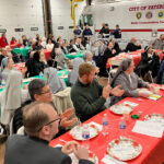 Paterson Firefighters host Christmas dinner to honor late ‘guardian angel’ religious sister #Catholic - Members of the Paterson Fire Department held their annual home-cooked Christmas dinner on Dec. 2 at fire headquarters in memory of Sister of Charity Loretta Weingart and in honor of all living religious.
Sister Weingart was like a “mother-chaplain” to the firefighters of Paterson. She served what is now known as St. Joseph’s University Medical Center in Paterson. She kept vigil over injured or ill firefighters and their families as a “guardian angel.” In the 1990s, the firefighters started a dinner in her honor — an event that grew in attendance. Since her death in 2002, the department has held an annual Christmas dinner for religious, including her community, the Sisters of Charity of St. Elizabeth, and clergy.
At the dinner, religious offered a reciprocal “thank you” to the firefighters as front-line workers every day.

Click here to subscribe to our weekly newsletter.

Bishop Kevin J. Sweeney was present to greet everyone and give the meal blessing. Paterson Mayor Andre Sayegh also attended the dinner.
The Bishop said, “Thank you to the Paterson Fire Department for hosting the 33rd annual Christmas Dinner for religious sisters and brothers, priests, seminarians, and postulants. What a great meal, a great crowd, and a great night. Thanks also to the faculty, students, and alumni from DePaul Catholic High School in Wayne, Mayor Andre Sayegh, family members of the firefighters, and retired firefighters for helping us all feel the Christmas spirit.”
 [See image gallery at beaconnj.org]