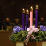 Perspectives on Advent #Catholic – As we light the first Advent candle this weekend, the real countdown to Christmas begins! Sure, the TV movies, Christmas songs on the radio, and decorating have already started, but the first Sunday of Advent makes the season official from a Christian perspective. And it’s always interesting to read what insights different people bring to the days leading up to the celebration of Jesus’ birth.
For instance, during Advent a couple of years ago, Christopher Award-winning author Amy Julia Becker took to her social media accounts to explore two Biblical figures’ very different responses to the news of Jesus’ coming. Becker wrote, “When Mary hears the message that she has been chosen by God to be the mother of Jesus, Luke tells us she was ‘troubled.’ When King Herod hears from the three magi that Jesus has been born, Matthew tells us he was ‘troubled.’ The news that Jesus is coming disrupts their lives.”
“Herod responds with denial and violence,” Becker continued. “Mary responds with surrender and acceptance and receptivity. The news of God’s love entering our world disrupts our expectations. It challenges us. It proclaims our belovedness apart from our achievements or worth. It exposes injustice. The news of God’s love entering the world invites us to healing and freedom. It threatens us with radical acceptance and grace. God’s love is a holy disruption that might trouble us deeply. How will we respond?”

Click here to subscribe to our weekly newsletter.

While we may think of Lent as a greater season of “holy disruption,” Advent can play a similar role in taking us out of ourselves to think more about loving God and neighbor. In fact, if you search for one online, you might find “Advent of Kindness” calendars to help you do just that—or you could create one of your own. Some suggestions:
While waiting on line in a store, allow someone to go in front of you. Get in touch with an old friend or relative whom you’ve lost contact with; if you had a disagreement with that person, try your best to make peace. Write a thank you note to someone, and express gratitude to anyone who helps you in the course of your day. Bake Christmas cookies for a neighbor or offer to help put up decorations if they’re unable to do so themselves. Give a meal to someone who is hungry. Learn about another person whose life or beliefs are different from yours and see if you can find some commonality. Pray—and work—to be more like Jesus, serving others with love.
Advent is also the perfect time to take part in opportunities for joy and community. That’s part of the reason Jen Sawyer has attended Fordham University’s annual Festival of Lessons and Carols for the past 20 years. Writing at Jesuits.org, Sawyer describes a scene in which a female soloist, holding a single candle in the darkened church, begins singing, “Once in royal David’s city.” The choir then joins in, “as the flame from the single candle is passed from choir member to choir member until the once-dark church is fully illuminated by candlelight.” This experience always resonates with Sawyer. She writes, “I listened attentively to the scriptural lessons and reflections, sang my heart out with my friends, and realized I was part of a community coming together in prayer and song to welcome Christ into our hearts.”
This Advent, may each of us find our own way to make the season meaningful and fulfilling.
For free copies of the Christopher News Note Imitating Christ’s Humility, write: The Christophers, 264 West 40th Street, Room 603, New York, NY 10018; or e-mail: mail@christophers.org
 