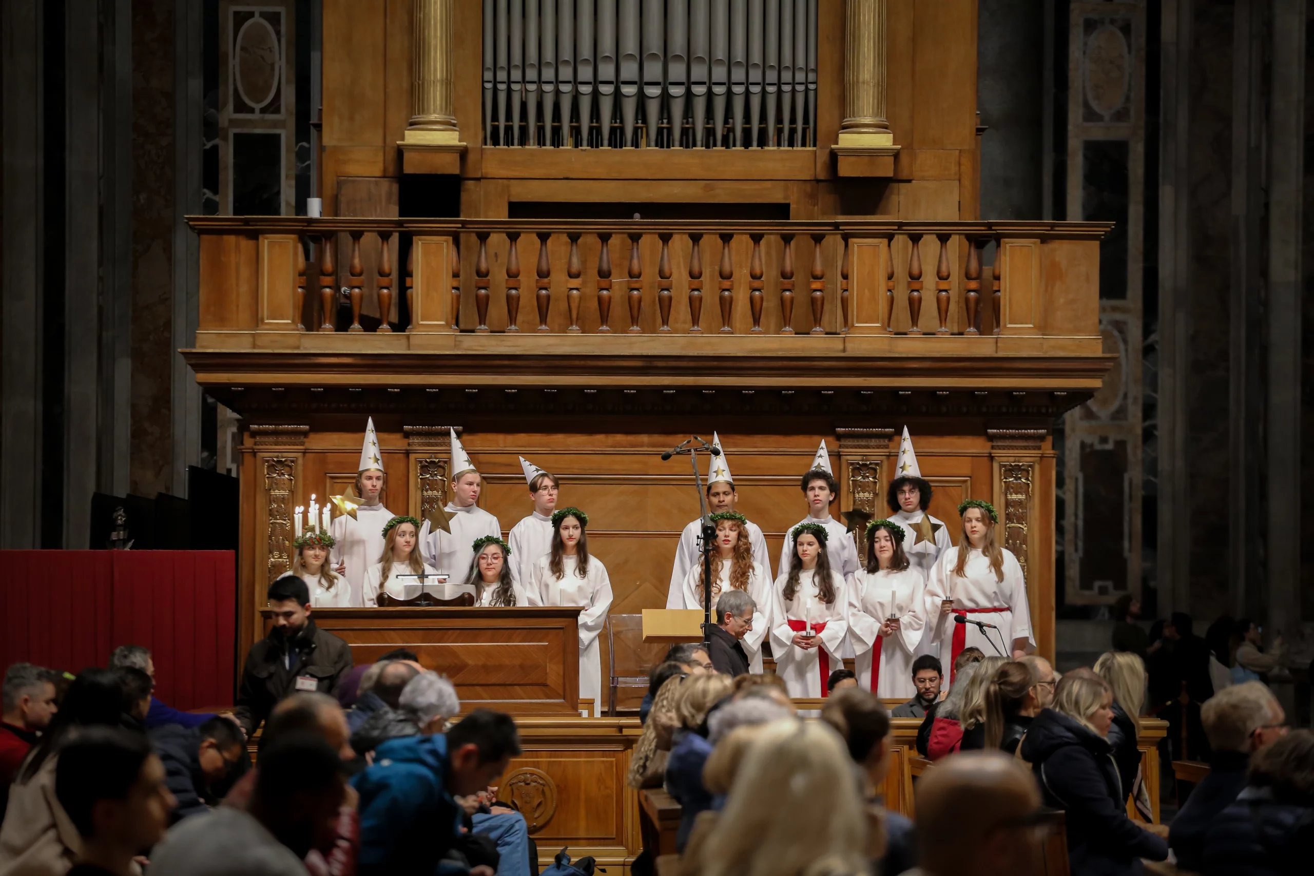 Swedish choir honors St. Lucy with songs in St. Peter’s Basilica - #Catholic - 
 
 Students from Nordiska Musikgymnasiet — The Nordic Music High School — in Stockholm perform traditional Swedish “Lucia songs” during an afternoon Mass in St. Peter’s Basilica on Dec. 11, 2025. / Credit: Bénédicte Cedergren/EWTN News

Rome Newsroom, Dec 13, 2025 / 09:00 am (CNA).
A Swedish youth choir marked the feast of St. Lucy by singing at a Mass at the Vatican on Thursday, Dec. 11.Students from Nordiska Musikgymnasiet — The Nordic Music High School — in Stockholm performed traditional Swedish “Lucia songs” during an afternoon Mass in St. Peter’s Basilica ahead of the Italian saint’s Dec. 13 feast day.Students from Nordiska Musikgymnasiet — The Nordic Music High School — in Stockholm perform traditional Swedish “Lucia songs” during an afternoon Mass in St. Peter’s Basilica on Dec. 11, 2025. Credit: Bénédicte Cedergren/EWTN News“It was just really amazing” singing in St. Peter’s Basilica, choir member Alfio Tota told EWTN News after the Dec. 11 Mass. “It’s so enormous … And the acoustics are very interesting.”The student recalled that though Sweden is a very secular country, the tradition of St. Lucia, as they call her, is quite strong.Students from Nordiska Musikgymnasiet — The Nordic Music High School — in Stockholm perform traditional Swedish “Lucia songs” during an afternoon Mass in St. Peter’s Basilica on Dec. 11, 2025. Credit: Bénédicte Cedergren/EWTN News“I think everyone feels quite a lot of joy and nostalgia in singing” the St. Lucy hymns, he said.Choir member Fabienne Glader told EWTN News that she always spends the feast of St. Lucy with her family.Students from Nordiska Musikgymnasiet — The Nordic Music High School — in Stockholm perform traditional Swedish “Lucia songs” during an afternoon Mass in St. Peter’s Basilica on Dec. 11, 2025. Credit: Bénédicte Cedergren/EWTN NewsSt. Lucy “shows courage and patience and just to never [give up] on yourself,” Glader said. “Even if you’re not really religious in any way, you can look up to her as just a wonderful person.”The choir’s conductor, Casimir Käfling, said as a Christian, the tradition of St. Lucy was always part of Christmas for his family.Students from Nordiska Musikgymnasiet — The Nordic Music High School — in Stockholm perform traditional Swedish “Lucia songs” during an afternoon Mass in St. Peter’s Basilica on Dec. 11, 2025. Credit: Bénédicte Cedergren/EWTN NewsHe called it “an incredible honor to be able to sing and conduct” her songs in St. Peter’s Basilica.Käfling also recalled the darkness Sweden experiences during the winter, especially in the month of December, and said St. Lucy brings light into that darkness.“The story of St. Lucy really plays with these contrasts of light and dark, and most importantly, hope and despair,” Tota said.
