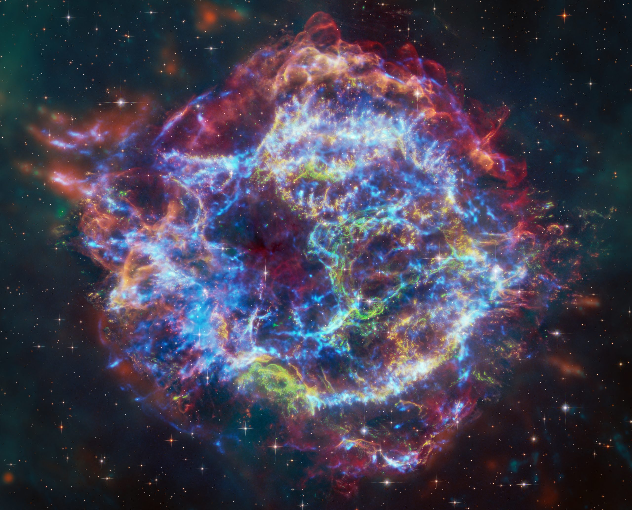 XRISM Finds Chlorine, Potassium in Cas A – This composite image of the Cassiopeia A (or Cas A) supernova remnant, released Jan. 8, 2024, contains X-rays from Chandra (blue), infrared data from Webb (red, green, blue), and optical data from Hubble (red and white). A study by the XRISM (X-ray Imaging and Spectroscopy Mission) spacecraft has made the first-ever X-ray detections of chlorine and potassium in the wreckage.