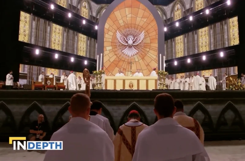 Catholic music debate: Should certain hymns be banned? #Catholic
Scene from the 2024 National Eucharistic Congress in Indianapolis, Indiana. / Credit: EWTN News in Depth/Screenshot
Washington, D.C. Newsroom, Oct 18, 2025 / 12:00 pm (CNA).
Several hymns were temporarily banned last year in the Diocese of Jefferson City, Missouri after being found “to be insufficient in sound doctrine,” with the action raising questions about what music is allowed at the Holy Mass.In a special report for the Oct. 17, 2025 edition of “EWTN News In Depth,” correspondent Mark Irons explored the subject. Archbishop Shawn McKnight, who implemented the brief ban, told Irons: “I would hope everybody else learns from my mistake.”McKnight, who was the bishop of Jefferson City at the time, now serves as the archbishop of Kansas City. The controversial ban in question encompassed 12 songs in total, including the popular hymns “I am the Bread of Life” and “All Are Welcome.” McKnight said the decree was implemented too quickly and without enough discussion among Catholics in the diocese. Currently, no particular hymns are excluded in the Diocese of Jefferson City, but parishes are required to evaluate Mass music using guidelines that were provided for archdioceses and dioceses across the nation by the U.S. Conference of Catholic Bishops (USCCB).The USCCB’s 2020 “Catholic Hymnody at the Service of the Church: An Aid for Evaluating Hymn Lyrics” was created to make sure Mass hymns are in conformity with Catholic doctrine. The bishops list a number of specific concerns regarding hymns, including ones with “deficiencies in the presentation of Eucharistic doctrine,” those “with a view of the Church that sees Her as essentially a human construction,” or songs with “an inadequate sense of a distinctively Christian anthropology.”Kevin Callahan, who serves as the music director at Sacred Heart Parish in Glyndon, Maryland, told Irons: “We believe…the body and blood, soul and divinity of Christ is here at the Mass, in the Eucharist. The songs, of course, should reflect that.” Callhan explained that he understands why the bishops would create the aid. The bishops “want the right thing to be said in Church, they don’t want the wrong idea to get tossed around.” Callahan said he does believe there are certain hymns that could be misleading. The ‘pride of place” of Gregorian chantOver time, Callahan said, Gregorian chant has earned pride of place within the liturgy of the Mass.This was reflected in the Second Vatican Council document Sacrosanctum Concilium, which explains: “The Church acknowledges Gregorian chant as specially suited to the Roman liturgy.” Sara Pecknold, a professor of liturgical music at Christendom College, noted that “Gregorian chant, beyond a shadow of a doubt, was developed with and for the liturgy.” “The Second Vatican council teaches us that the more closely tied the music is to the liturgical action…the more sacred it is,” she pointed out.RecommendationsIf Gregorian chant is unfamiliar to a parish, Pecknold recommends small steps that could be taken. She said: “I would first start with the very simplest chant melodies, for the ordinaries of the Mass.”Beyond Gregorian chant, the Second Vatican Council decided that the Church approves “of all forms of true art having the needed qualities, and admits them into divine worship.” Pecknold explained: “Liturgical music should glorify God and it should sanctify and edify all of us who are present at this great sacrifice.”Welcoming a diversity of stylesDave Moore, the music director at the 2024 U.S. National Eucharistic Congress, was in charge of bringing together a wide variety of Catholic musicians from across the country for the event.Moore said the musical goal of the Congress was to create a unity rooted in Christ, through different styles of music.”I don’t know how you find unity without diversity,” Moore said. “There’s a lot of people who do things differently than we’re used to, but what we’re looking for is the heart, like are you pursuing the heart of God?”Archbishop McKnight also noted the need for variety. “Catholicity means there’s a universality to who we are, that we’re not of just one kind or one culture, but there’s a diversity of charisms and a diversity of styles,” he said. “The fact that there are different ways of entering into the mystery of Christ, actually increases the unity we have, otherwise we’re just a church of some, and not the Church of all.”Music is “often associated with memories and emotions, too,” he said. “That’s a part of our celebration of the Eucharist. It’s not just a thing of the mind. It’s not just a doctrinal assent. It’s also a movement of the heart and ultimately it’s active prayer.”“Hymns that are liked by the people are a good choice, but it’s also important that they convey the Catholic faith,” McKnight said. “It’s about discernment of the will of God and what the Holy Spirit wants.” Catholic music debate: Should certain hymns be banned? #Catholic
Scene from the 2024 National Eucharistic Congress in Indianapolis, Indiana. / Credit: EWTN News in Depth/Screenshot
Washington, D.C. Newsroom, Oct 18, 2025 / 12:00 pm (CNA).
Several hymns were temporarily banned last year in the Diocese of Jefferson City, Missouri after being found “to be insufficient in sound doctrine,” with the action raising questions about what music is allowed at the Holy Mass.In a special report for the Oct. 17, 2025 edition of “EWTN News In Depth,” correspondent Mark Irons explored the subject. Archbishop Shawn McKnight, who implemented the brief ban, told Irons: “I would hope everybody else learns from my mistake.”McKnight, who was the bishop of Jefferson City at the time, now serves as the archbishop of Kansas City. The controversial ban in question encompassed 12 songs in total, including the popular hymns “I am the Bread of Life” and “All Are Welcome.” McKnight said the decree was implemented too quickly and without enough discussion among Catholics in the diocese. Currently, no particular hymns are excluded in the Diocese of Jefferson City, but parishes are required to evaluate Mass music using guidelines that were provided for archdioceses and dioceses across the nation by the U.S. Conference of Catholic Bishops (USCCB).The USCCB’s 2020 “Catholic Hymnody at the Service of the Church: An Aid for Evaluating Hymn Lyrics” was created to make sure Mass hymns are in conformity with Catholic doctrine. The bishops list a number of specific concerns regarding hymns, including ones with “deficiencies in the presentation of Eucharistic doctrine,” those “with a view of the Church that sees Her as essentially a human construction,” or songs with “an inadequate sense of a distinctively Christian anthropology.”Kevin Callahan, who serves as the music director at Sacred Heart Parish in Glyndon, Maryland, told Irons: “We believe…the body and blood, soul and divinity of Christ is here at the Mass, in the Eucharist. The songs, of course, should reflect that.” Callhan explained that he understands why the bishops would create the aid. The bishops “want the right thing to be said in Church, they don’t want the wrong idea to get tossed around.” Callahan said he does believe there are certain hymns that could be misleading. The ‘pride of place” of Gregorian chantOver time, Callahan said, Gregorian chant has earned pride of place within the liturgy of the Mass.This was reflected in the Second Vatican Council document Sacrosanctum Concilium, which explains: “The Church acknowledges Gregorian chant as specially suited to the Roman liturgy.” Sara Pecknold, a professor of liturgical music at Christendom College, noted that “Gregorian chant, beyond a shadow of a doubt, was developed with and for the liturgy.” “The Second Vatican council teaches us that the more closely tied the music is to the liturgical action…the more sacred it is,” she pointed out.RecommendationsIf Gregorian chant is unfamiliar to a parish, Pecknold recommends small steps that could be taken. She said: “I would first start with the very simplest chant melodies, for the ordinaries of the Mass.”Beyond Gregorian chant, the Second Vatican Council decided that the Church approves “of all forms of true art having the needed qualities, and admits them into divine worship.” Pecknold explained: “Liturgical music should glorify God and it should sanctify and edify all of us who are present at this great sacrifice.”Welcoming a diversity of stylesDave Moore, the music director at the 2024 U.S. National Eucharistic Congress, was in charge of bringing together a wide variety of Catholic musicians from across the country for the event.Moore said the musical goal of the Congress was to create a unity rooted in Christ, through different styles of music.”I don’t know how you find unity without diversity,” Moore said. “There’s a lot of people who do things differently than we’re used to, but what we’re looking for is the heart, like are you pursuing the heart of God?”Archbishop McKnight also noted the need for variety. “Catholicity means there’s a universality to who we are, that we’re not of just one kind or one culture, but there’s a diversity of charisms and a diversity of styles,” he said. “The fact that there are different ways of entering into the mystery of Christ, actually increases the unity we have, otherwise we’re just a church of some, and not the Church of all.”Music is “often associated with memories and emotions, too,” he said. “That’s a part of our celebration of the Eucharist. It’s not just a thing of the mind. It’s not just a doctrinal assent. It’s also a movement of the heart and ultimately it’s active prayer.”“Hymns that are liked by the people are a good choice, but it’s also important that they convey the Catholic faith,” McKnight said. “It’s about discernment of the will of God and what the Holy Spirit wants.”