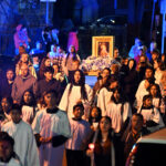 More than 1,000 find hope during Passaic rosary procession #Catholic - As a statue of the Blessed Mother passed through the city streets of Passaic, N.J., for five miles, Catholics found a moment of hope. On Oct. 10, more than 1,000 people from all eight Catholic churches in the city participated in a rosary procession. This annual tradition takes place in the Passaic during October, the Month of the Holy Rosary. This year’s procession marked the first time Bishop Kevin J. Sweeney joined the walk at Bishop Paterson.
The procession began at St. Anthony of Padua Church. It ended at the Diocesan Shrine of St. John Paul II/Holy Rosary Church with stops at five other Catholic churches in the city. They were Holy Trinity, St. Joseph, St. Mary of the Assumption, Our Lady of Fatima/St. Nicholas and St. Stephen.
All four mysteries of the rosary — Joyful, Glorious, Sorrowful, and Luminous — were recited with prayers in English, Spanish, Polish, and Hungarian, reflecting the diversity of the city, which is historically known as a first dwelling place for immigrants coming to the United States.

Click here to subscribe to our weekly newsletter.

People of all ages walked— from mothers holding their infants to older individuals walking with canes.
Hundreds participated in the procession throughout the city for almost three hours. Many stood on the sidewalk and from their homes, looking out their windows and from their front steps to see the procession.
On a mountain of white flowers, a statue of Our Lady of Guadalupe stood on the bed of a pickup truck. Each parish also carried statues of the Blessed Mother along with banners with the name of the parish.
BEACON PHOTOS | JOE GIGLI
 [See image gallery at beaconnj.org]  
