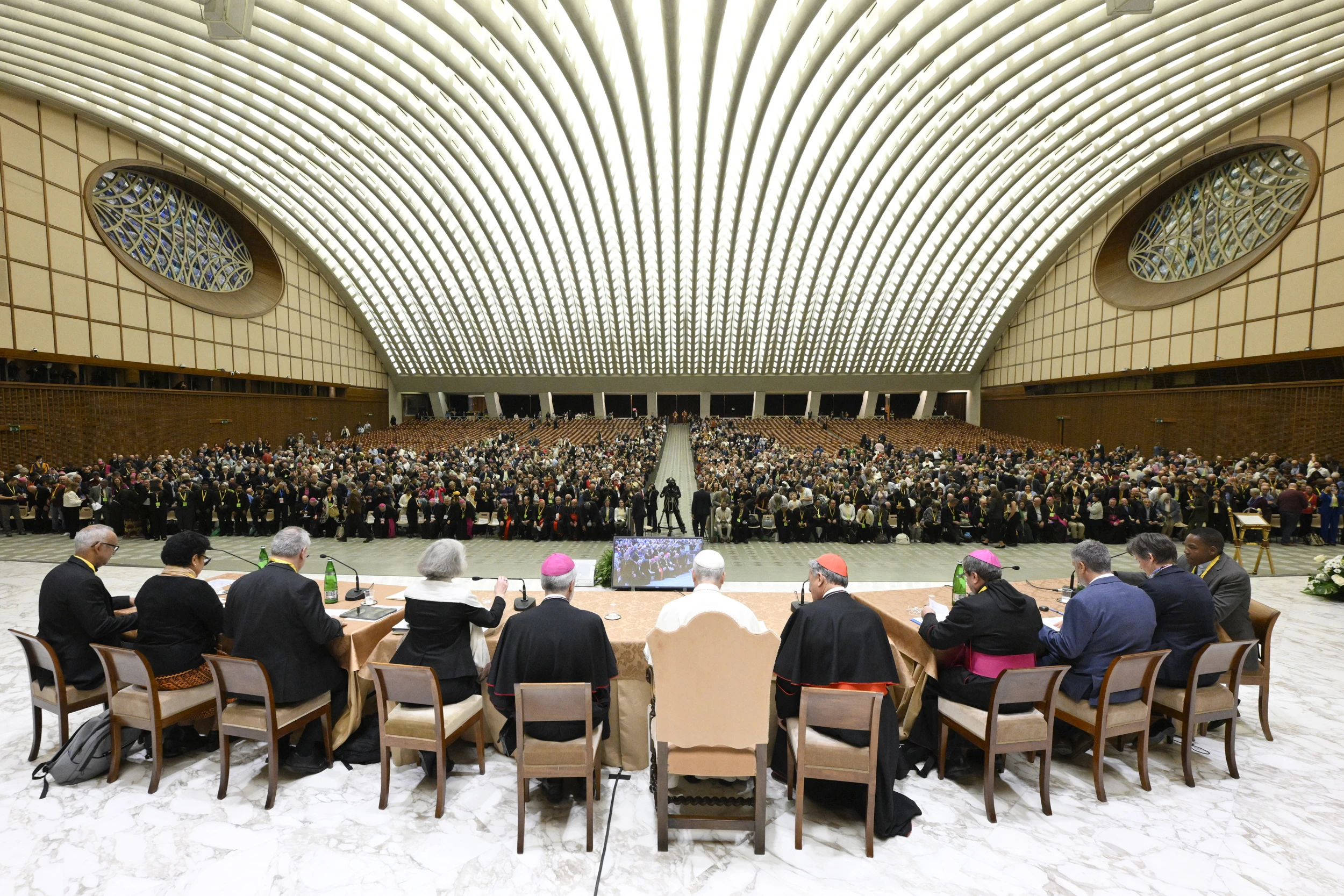 Pope Leo XIV: There’s no template for synodality across all countries - #Catholic - 
 
 Pope Leo XIV sits next to Cardinal Mario Grech, general secretary of the Vatican's synod office, during the jubilee of synod teams and participatory bodies in the Vatican's Paul VI Hall on Oct. 24, 2025. / Credit: Vatican Media

Vatican City, Oct 25, 2025 / 12:00 pm (CNA).
There is no single model for what synodality should look like in all countries and cultures, Pope Leo XIV said in a discussion with synod leaders from around the globe, held at the Vatican on Friday.“We have to be very clear, we’re not looking for a uniform model. And synodality will not come with a template where everybody and every country will say this is how you do it,” the pope said in the Paul VI Hall Oct. 24. “It is, rather, a conversion to a spirit of being Church, and being missionary, and building up, in that sense, the family of God.”Leo spoke about synodality in unscripted remarks in English, Spanish, and Italian during the opening session of a meeting for the jubilee of synodal teams and participatory bodies, taking place in Rome Oct. 24-26, part of the Church’s wider 2025 Jubilee of Hope.Around 2,000 people are attending the synod-focused jubilee, which includes a two-day meeting “aimed at translating the orientations of the [Synod on Synodality’s] Final Document into pastoral and structural choices consistent with the synodal nature of the Church,” according to the Vatican’s synod office.Pope Leo XIV listens to reports from seven representatives around the world about the implementation of synodality on their continents during the jubilee of synodal teams and participatory bodies at the Vatican on Oct. 24, 2025. Credit: Vatican Media.The pope joined part of the program on Friday evening to listen to representatives from different regions give reports on the implementation of synodality in their parts of the world, and to answer their questions about the synodal process. Synodality, Leo said, “is to help the Church fulfill its primary role in the world, which is to be missionary, to announce the Gospel.”He added that synodality “is not a campaign. It’s a way of being and a way of being Church. It’s a way of promoting an attitude, which begins with learning to listen to one another.”The pope recalled the value of listening, “beginning with listening to the Word of God, listening to one another, listening to the wisdom we find in men and in women, in members of the Church, and those who are searching who might not yet be members of the Church.”He also addressed resistance to the synodal process, such as worry by some that it is an attempt to weaken the authority of the bishop.“I would like to invite all of you … to reflect upon what synodality is about and to invite the priests particularly, even more than the bishops, to somehow open their hearts and take part in these processes,” Leo said. “Often the resistance comes out of fear and lack of knowledge.”He emphasized the need to prioritize formation and preparation at every educational level.“Sometimes ready answers are given without the proper, necessary preparation to arrive at the conclusion that maybe some of us have already drawn, but others are not ready for or capable to understand,” he said.“We have to understand that we do not all run at the same speed. And sometimes we have to be patient with one another,” Leo said. “And rather than a few people running ahead and leaving a lot behind, which could cause even a break in an ecclesial experience, we need to look for ways, very concrete ways at times, of understanding what’s happening in each place, where the resistances are or where they come from, and what we can do to encourage more and more the experience of communion in this Church which is synodal.”Asked if groupings of churches, such as regional bishops’ conferences, will continue to grow in the life of the Church, Leo said, “the brief answer is yes, I do expect that, and I hope that the different groupings of churches can continue to grow as expressions of communion in the Church using the gifts we are all receiving through this exercise if you will, this life, this expression of synodality.”The pontiff also weighed in on the topic of women and their participation in the Church, though he set aside the most controversial questions, which he said are being examined in a separate study group.“So leaving aside the most difficult themes,” he said, “there are cultural obstacles, there are opportunities, but there are cultural obstacles. And this has to be recognized, because women could play a key role in the Church, but in some cultures women are considered second-class citizens and in some realities they do not enjoy the same rights as men.”“In these cases, there is a challenge for the Church, for all of us, because we need to understand how we can promote the respect for the rights of everyone, men and women,” he encouraged.The Church can promote a culture in which there is co-participation of every member of society, each according to their vocation, Leo continued. “We have to understand how the Church can be a strength to transform cultures according to the values of the Gospel.”