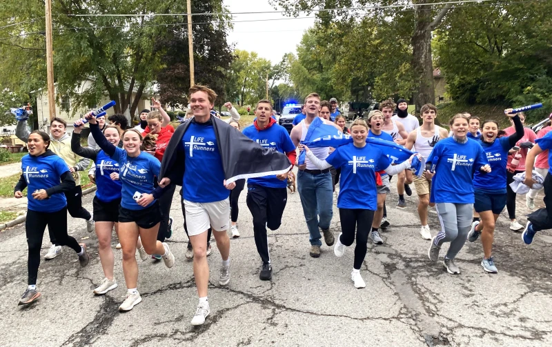 10,000 pro-lifers join LIFE Runners annual relay across the U.S. #Catholic 
 
 Finish line of the A-Cross America Relay, hosted by Benedictine College in Atchison, Kansas. / Credit: Photo courtesy of LIFE Runners.

CNA Staff, Nov 1, 2025 / 05:55 am (CNA).
A pro-life relay with more than 10,000 participants came to a joyful conclusion in Kansas last Saturday after runners made the shape of a cross as they ran across the U.S.The 5,124 mile “A-Cross America Relay,” organized by pro-life group LIFE Runners, kicked off in September in four cities around the country and ended at Benedictine College in Atchison, Kansas on Oct. 25.The starting points were San Francisco, California; New York City, New York; Austin, Texas; and Fargo, North Dakota, but participants around the world also joined to witness to life in their own nations. The San Francisco kickoff of the A-Cross America Relay began at Star of the Sea Church with students from Stella Maris Academy. Credit: Photo courtesy of LIFE Runners.With more than 25,000  “teammates” in nearly 4,000 cities across 50 countries, LIFE Runners aim to raise awareness for unborn children during their annual relay. Patrick Castle, president and founder of LIFE Runners, spoke with CNA about what inspires participants to run for the unborn.  CNA: What inspires the mission of LIFE Runners? Castle: LIFE Runners is inspired by the obvious responsibility of Christians to reach the youth, pregnant mothers, fathers, and influencers with God's love and the truth that abortion isn't a solution to anything, it is the greatest problem, the greatest evil by definition, by the numbers. Abortion claims more American lives in one year than all combat casualties in the history of America.  With the 250th anniversary of our country next year, may we reflect on who we are as Americans and as Christians. We are people who stand for God and His gifts of life and liberty. Amen!How does the relay help raise awareness for the unborn?Castle: The LIFE Runners A-Cross America Relay helps raise awareness for the unborn through our public witness [of] wearing “REMEMBER The Unborn” shirts.  Eighty-two percent of post-abortion mothers said if they had encountered one supportive person or encouraging message, they would have chosen life. For example, two mothers saw our “REMEMBER The Unborn” witness outside of the Omaha Planned Parenthood, asked for help, and chose life. New York City kickoff for the A-Cross America Relay. Participants prayed and then walked with the big “REMEMBER The Unborn” banner to the Father Francis Duffy statue in Times Square. Credit: Photo courtesy of LIFE Runners.Thousands of people witnessed thousands of LIFE Runners wearing "REMEMBER The Unborn" shirts across America and around the world during the 5,124 mile relay that made a cross over America.  With access to abortion in the mail and across state lines, LIFE Runners wear life-saving messages everywhere to inspire a culture of life at work, school, walking, running, grocery store; everywhere! What stood out to you from the finish line relay at Benedictine College in Atchison, Kansas? Castle: I am so encouraged by the authentic, Catholic, pro-life identity of Benedictine College … While running up the hill, students invited other students to join us, like a scene out of the "Rocky" movie when the local community joined him on a training run. The last mile ended on the main campus drive with President [Stephen] Minnis leading a large crowd with cheering. The finish was immediately followed by a beautiful prayer from Archbishop [Joseph]Naumann.What is the significance of having a national relay across the United States? Castle: The significance of having a relay that makes a cross over America is unity. [The relay] connects everyone in a pro-God way, allowing faith and light to overcome the darkness to end abortion — all in Christ for pro-life! Teammates in other countries adopt segments, knowing that America can and should lead the way in ending abortion around the world.  The relay is an inspiring light for the world. The cross is the greatest symbol of love, bringing hope that life will prevail!The North arm kickoff of the A-Cross America Relay in Fargo, North Dakota. NDSU Newman Center students helped launch the north arm with a 2.7 mile prayerful witness walk. Credit: Photo courtesy of LIFE Runners.