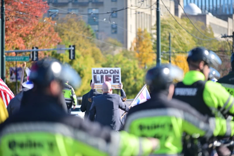Amid clown protesters, Boston men’s march for life remains ‘prayerful’ #Catholic 
 
 Police protect marchers at the fourth annual National Men’s March to Abolish Abortion and Rally for Personhood in Boston on Nov. 1, 2025. / Credit: Brother Anthony Marie MICM

CNA Staff, Nov 8, 2025 / 09:00 am (CNA).
Here is a roundup of recent pro-life and abortion-related news:Amid clown protesters, Boston men’s march for life remains ‘prayerful’Hundreds gathered in Boston last Saturday for a men’s march for life, which drew a rambunctious crowd of protesters dressed as clowns and inflatable dinosaurs. The fourth annual National Men’s March to Abolish Abortion and Rally for Personhood began at Boston Planned Parenthood and concluded about three miles away at Boston Common.While counterprotesters — some dressed as clowns or wearing inflatable dinosaur costumes — played instruments and yelled on the sidelines, marchers carried on in a “prayerful and well-composed” manner, said march co-founder and president Jim Havens, who called the event “outstanding.” At the rallying point at Boston Common, an estimated 50 Antifa members also showed up. Another counterprotester wore a pony costume and carried a megaphone. Though the event sees protesters every year, Havens told CNA that the marchers have a good relationship with local law enforcement, so the event is “safe and secure.” “In our current culture of death, when we publicly stand for the least among us and for the abolition of the ongoing daily mass murder of our littlest brothers and sisters, protesters are to be expected,” Havens said. “We strive to incorporate the protesters into those for whom we pray as we march.” A marching band from the American Society for the Defense of Tradition, Family, and Property also participated to counterbalance the noise of the counterprotesters. The march invites men “to step forward to protect the women and children,” Havens explained. The idea that abortion is not a men’s issue is “nonsense,” Havens said. “As men, we have a moral responsibility to protect and defend vulnerable women and children, and it’s time we all get off the sidelines and do so,” Havens said. Speakers included Sister Deirdre Byrne, pro-life activist Will Goodman, and Bishop Joseph Strickland, among others.“As we marched, there was a sense among the men that we were simply being true to who we are as men,” Havens said.“Now active in the urgent fight for abolition, these men will not be going back to the sidelines,” he said. “Instead, they are now asking, ‘What more can I do?’”South Carolina man arrested for threatening pro-lifers with grenade A group was gathered outside a South Carolina church on a Sunday morning to protest board members’ involvement with abortion funds when a man threatened them with a grenade. Video footage shows Richard Lovelace, 79, holding up a grenade, saying: “I have a grenade for y’all, a gift for you protesters.”  After Lovelace was arrested, police found that the grenade was hollowed out.Lovelace, a member of St. Anne Episcopal Church, is a retired lawyer whose wife is on the church’s board and is a judge in South Carolina. The Survivors of the Abortion Holocaust group was protesting the board’s involvement with the Palmetto State Abortion Fund, a group that partners with Planned Parenthood to bring illegal abortion pills into the state and helps women travel out of state for abortions.Police charged Lovelace with four counts of having a hoax device and threatening to use it. On Monday, he was released from the J. Reuben Long Detention Center on a ,000 bond. Nebraska governor signs order barring abortion providers from state fundingNebraska Gov. Jim Pillen on Nov. 6  issued an executive order preventing abortion providers from receiving taxpayer funding in Nebraska. While the federal law and some state laws prevent taxpayer funding from going directly to abortion, state governments often subsidize providers for other services, therefore indirectly funding abortion. In Nebraska in 2025, more than 0,000 went to abortion providers, according to the governor’s office. President Donald Trump’s One Big Beautiful Bill Act recently prohibited federal funds from going toward abortion providers for one year. Pillen said he is “proud that we can take this bold step in halting funding to abortion providers that receive Medicaid funding.” “Nebraskans have made clear they support a culture of love and life in our state — one that provides protections for the unborn,” he said in a press release. Attorney General Mike Hilgers said the issue has “been in the background for a long time for a lot of people.”“In fact, the desire of Nebraska taxpayers to not have their funds be used for abortions has been in state statutes for some time,” Hilgers noted.Thousands gather for Michigan March for LifeThousands gathered for the March for Life in Lansing, Michigan, on Thursday, Nov. 6.March for Life president Jennie Bradley Lichter, who spoke at the event, called the march a chance to “send a vital message to our legislators who have the power to support women, children, and families.” “The women of Michigan deserve better than the tragedy of abortion, and we want them to know we are here for them, no matter what they are facing,” Lichter said in a statement shared with CNA.Bishop Earl Boyea of Lansing as well as Knights of Columbus State Deputy Barry Borsenik spoke at the event. Michigan state lawmakers including state Rep. Ann Bollin, state Sen. John Damoose, and state Rep. Jennifer Wortz also spoke at the event. President of Right to Life Michigan Amber Roseboom said the pro-life movement in Michigan stands with women facing unplanned pregnancies. “While a woman in Michigan can have an abortion at any point in her pregnancy for any reason, no woman should ever be made to feel that abortion is the best or only option,” she said in a statement shared with CNA.  “Pro-lifers from across our state have a powerful message for women facing unplanned pregnancies: You are not alone! We stand with you. We stand for you,” Roseboom said.