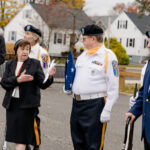 Holy Spirit School honors veterans with heartfelt ceremony #Catholic - Holy Spirit School in Pequannock, N.J., honored and remembered the brave men and women who have selflessly served the United States both at home and abroad during a Veterans Day ceremony on Nov. 11.
Students, teachers, parents, and guests filled the gym. They welcomed members from American Legion Post 450, including Dennis Porpora, Daniel Boyle, Pat McKevor, and Morris County American Legion Vice Commander Dominick Sabol Sr. The ceremony began with a prayer of gratitude for all who serve or have served and a moment of silence for those who made the ultimate sacrifice.
Filippini Sister Marie Antonelli, principal of Holy Spirit School, spoke about the importance of Veterans Day. She reminded students that when they see men and women in military uniform, they should express gratitude and remember the many freedoms and liberties that we enjoy as Americans.

Click here to subscribe to our weekly newsletter.

Several Holy Spirit School families who have served in the U.S. Armed Forces joined the celebration, including Gregory Mazloom (U.S. Navy), Brady Moore (U.S. Army Green Berets), and Andrew Exposito (U.S. Marine Corps).
During the ceremony, Mazloom shared his experiences serving in the Navy, speaking about teamwork, perseverance, and the honor of representing the United States. His words encouraged students to appreciate the freedoms they enjoy and recognize the sacrifices made to protect them.
Mazloom and Moore led a flag-folding demonstration. The gymnasium fell silent for the playing of “Taps” by eighth grader Christiano Levia on the trumpet.
McKevor, one of Holy Spirit School’s earliest alumni and a veteran, was specially recognized for his service to the nation and lifelong dedication to the Holy Spirit community. He shared memories from his student days and expressed his joy at seeing the next generation continue the school’s traditions.
Paul J. Hirsch is the academic dean and technology coordinator, and an eighth-grade religion teacher at Holy Spirit School in Pequannock, N.J.
PHOTOS | PAUL J. HIRSCH
 [See image gallery at beaconnj.org]