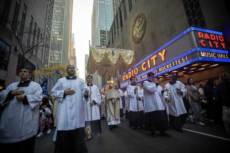New York sees rising Catholic conversions amid broader national trends – #Catholic – 
 
 A Eucharistic procession sponsored by the Napa Institute passes by Radio City Music Hall in New York City on Oct. 15, 2024. / Credit: Jeffrey Bruno

CNA Staff, Nov 18, 2025 / 15:35 pm (CNA).
A rising number of New Yorkers are reportedly converting to the Catholic Church, with the spike in converts coming as the U.S. bishops say increasing numbers of men and women are coming into the faith in this country. The New York Post found that multiple New York City Catholic churches have year-over-year double or even triple the number of adults signing up to become Catholic through the Order of Christian Initiation of Adults (OCIA). At one parish, St. Joseph’s Church in Greenwich Village, interest in OCIA tripled since last year, with about 130 people signing up, according to the paper. At St. Vincent Ferrer on the Upper East Side, numbers have doubled to nearly 90 participants.Sign-ups at the Basilica of St. Patrick’s Old Cathedral also doubled to about 100, according to the report.Many converts reportedly cited the Sept. 10 assassination of Charlie Kirk as a motivator for their conversions. In addition to his political activism, Kirk, an evangelical Protestant, often spoke about the importance of faith in God.This report follows a trend of rising OCIA numbers throughout the U.S.The National Catholic Register, CNA’s sister news partner, reported in April on rising conversions across dioceses. Many new Catholics cited immigration, evangelization, and the National Eucharistic Revival as reasons they found their way into the Catholic Church last Easter.   The U.S. bishops last week during their annual fall assembly in Baltimore also noted these rising numbers in a discussion about the National Eucharistic Revival as they approved the next National Eucharistic Congress for 2029.Bishop Andrew Cozzens of Crookston, Minnesota, who spearheaded the most recent congress, said during a session on Nov. 12 that the revival was “a time of great grace for the Church in the United States.”His diocese, he said, had its largest OCIA class in 20 years.During the session, the bishops offered a show of hands of those who had large numbers of OCIA participants in their dioceses, with many bishops indicating rising numbers of converts. “Praise God. Let’s hope that this trend continues,” Cozzens said at the time.