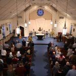 Parish celebrates 100 years as pioneering Wayne church #Catholic - On Nov. 9, Holy Cross Parish celebrated a century of vibrant faith and service as the Roman Catholic mother church of Wayne, N.J., during a Mass with Bishop Kevin J. Sweeney, who served as the celebrant and homilist.
The Mass was concelebrated by Father Peter VB Wells, pastor of Holy Cross and its twin parish, Our Lady of the Valley (OLV), also in Wayne, and director of cemeteries of the Paterson Diocese in New Jersey; Father Edward Lambro, a retired diocesan priest and a weekend assistant of the two parishes; and Father Duberney Villamizar, pastor of St. Margaret of Scotland Parish in Morristown, N.J., diocesan vicar of Hispanic Affairs, and a former parochial vicar of the parishes.
The first Roman Catholic church in Wayne, Holy Cross, officially began in 1925 as a mission of the Franciscan Friars of St. Bonaventure’s Monastery in Paterson, N.J. Today, Wayne is home to four other parishes established after Holy Cross: OLV and Immaculate Heart of Mary, both in 1960, and Our Lady of Consolation and Annunciation, both in 1963. Holy Cross is on Van Duyne Avenue in the Mountain View section of Wayne.

Click here to subscribe to our weekly newsletter.

“Holy Cross is a parish of people who are faithful and dedicated. The congregation loves to sing hymns at Mass. They are also generous,” said Father Wells, pastor of OLV and Holy Cross since 2015.
Today, Holy Cross, which ministers to 300 families, offers a Mass on Sunday and another on Saturday. Parishioners conduct a Christmas outreach to St. Agnes Parish in Paterson; support Several Sources, a non-profit organization that helps pregnant women and new mothers; and donate to the food pantry of Father English Community Center, also in Paterson.
The Franciscans started offering bi-monthly Masses in the area in 1905. In 1925, they bought a home on Route 23 and renovated it as a mission chapel. Father Luke Panfoerder became the first pastor in 1929, when the mission was elevated to a parish. The cornerstone for the present church was laid in 1934, when Holy Cross consisted of 93 families.
The friars continued to serve the mission until 1945, when Bishop Thomas McLaughlin erected Holy Cross as a parish under the care of diocesan clergy. In 1950, Holy Cross opened a parish school, the first Catholic school in Wayne, which later closed. Around 2010, Holy Cross became twinned with OLV, a parish of 5,000 families. Both faith communities remain separate parishes.
BEACON PHOTOS | JOE GIGLI
 [See image gallery at beaconnj.org]  