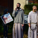 Participants of Morristown Mass, rosary procession advocate ‘Choose Life’ #Catholic - On the morning of Nov. 1, a large gathering of Catholic faithful carried powerful messages through the streets of Morristown, N.J. — such as “Choose Life” and “Adoption: the Loving Option” — during Bishop Kevin J. Sweeney’s monthly Mass and Rosary Procession for Life.
The event started with Bishop Sweeney celebrating Mass at St. Margaret of Scotland Parish in Morristown. Father Duberney Villamizar, St. Margaret’s pastor and diocesan vicar for Hispanic affairs, and Father Sebastian Munoz Chavarria, the parish’s parochial vicar, concelebrated the Mass with the bishop.

Click here to subscribe to our weekly newsletter.

After the Mass, Bishop Sweeney led the participants — clergy, religious, and laity — in a procession to Planned Parenthood on Speedwell Avenue. A few of them carried signs in English and Spanish that promoted respect for life as they prayed the rosary for an end to abortion. Alyssa Renovales, Respect Life coordinator of the Paterson Diocese in New Jersey, joined the solemn procession.
A Mass and procession for life are held on the first Saturday of the month at 8 a.m. at St. Margaret’s. Priests and faithful from around the diocese are invited to join.
BEACON PHOTOS | JOE GIGLI
 [See image gallery at beaconnj.org]  