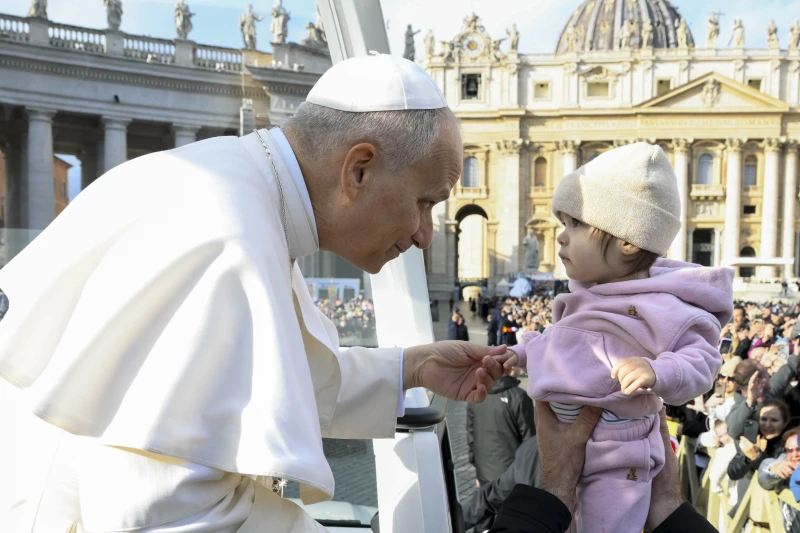 Pope Leo praises ‘wonderful adventure’ of parenthood despite hardships – #Catholic – 
 
 Pope Leo XIV greets a baby during the general audience in November 2025. / Credit: Vatican Media

Rome Newsroom, Nov 26, 2025 / 18:04 pm (CNA).
Pope Leo XIV praised “the wonderful adventure” of becoming parents that many families are choosing to embark on today, even in a time marked by economic and social difficulties.The pontiff dedicated part of Wednesday’s general audience to “trusting in the God of life,” and promoting humanity “in all its expressions,” above all in the “wonderful adventure of motherhood and fatherhood.”“In your families, may you never lack the courage to make decisions about motherhood and fatherhood. Do not be afraid to welcome and defend every child conceived. Proclaim and serve the Gospel of life. God is the lover of life. Therefore, always protect it with care and love,” he said in his greetings to the Polish-speaking pilgrims present in St. Peter’s Square.Pope Leo XIV acknowledged, however, that this vocation is developing today in a challenging context “in which families struggle to bear the burden of daily life.”Thus, he lamented that many families “are often held back in their plans and dreams” by these pressures, which can discourage couples from starting a family or expanding the one they already have.For the pontiff, family life also means committing to “an economy based on solidarity, striving for a common good equally enjoyed by all, respecting and caring for creation, offering comfort through listening, presence, and concrete and selfless help.”The Holy Father continued with his catechesis on “the Pasch of Christ,” which “ illuminates the mystery of life and allows us to look at it with hope,” although he acknowledged that this “is not always easy or obvious.”“Many lives, in every part of the world, appear laborious, painful, filled with problems and obstacles to be overcome,” he observed. However, he affirmed that human beings receive life as “a gift.” The pope then pointed to  “the questions of all ages” that have marked the history of human thought: “Who are we? Where do we come from? Where are we going? What is the ultimate meaning of this journey?”For the pontiff, “living” evokes “a hope” that acts as a “deep-seated drive” that “keeps us walking in difficulty, that prevents us from giving up in the fatigue of the journey, that makes us certain that the pilgrimage of existence will lead us home.”Society’s ‘sickness’: a lack of confidence in lifeDuring his reflections, the pope noted there is “a widespread sickness in the world”: a lack of confidence in life.This lack of confidence, he explained, takes the form of silent resignation, as if life were no longer perceived as a gift received, but as an unknown or even a “threat” against which it is advisable to protect oneself “so as not to end up disappointed.”In this context, the pope affirmed that the “value of living and of generating life” becomes an “urgent call” today, especially because — he noted, quoting the Book of Wisdom — God is the quintessential “lover of life” (Wisdom 11:26).The pope emphasized that “God’s logic” remains “faithful to his plan of love and life; he does not tire of supporting humanity even when, following in Cain’s footsteps, it obeys the blind instinct of violence in war, discrimination, racism, and the many forms of slavery.”The pope pointed to the resurrection of Jesus Christ as “the strength that supports us in this challenge even when the darkness of evil obscures the heart and the mind.”This story was first published by ACI Prensa, CNA’s Spanish-language news partner. It has been translated and adapted by CNA.