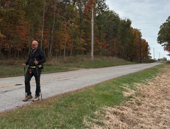 Priest walks from Illinois to New York against ‘inhumane’ immigration enforcement #Catholic 
 
 Father Gary Graf walks down a rural road during his trek across America in support of immigrants on Friday, Oct. 17, 2025. / Credit: Photo courtesy of Father Gary Graf

CNA Staff, Nov 24, 2025 / 06:00 am (CNA).
After a month and a half of walking an average of 17 miles a day, 67-year-old Father Gary Graf said he is starting to get “a little pain in one shin,” but his broken ribs are “getting much better.”On Oct. 6, Graf, a Catholic priest from Chicago, began a journey on foot from Pope Leo XIV’s childhood home in Dolton, Illinois, to New York City to bring attention to the plight of immigrants amid the sometimes “inhumane” ways the Trump administration is treating them during its immigration enforcement actions.He hopes to arrive at the Statue of Liberty on Ellis Island, where his own great-grandparents entered the country as immigrants, by Dec. 2.Father Gary Graf speaks to a fellow American at Red Horse Tavern in Pleasant Gap, Pennsylvania, Tuesday, Nov. 11, 2025. Credit: Photo courtesy of Father Gary GrafA few weeks ago, when visiting a parish in Indiana, he was invited to ride a horse. He fell off as it galloped and broke several ribs, which led him to take one day off to recover. That day, friends walked in his stead.Graf, the pastor of the mostly Hispanic Our Lady of the Heights Catholic Church in Chicago Heights and a longtime member of Priests for Justice for Immigrants, has committed his life to helping immigrants. Ordained in 1984, he spent five years as a priest in Mexico serving a people “with whom I fell deeply in love.”He told CNA that after initially feeling helpless watching the raids taking place against his beloved community in his hometown of Chicago, he “felt a call that was directly from above” to start walking.Father Gary Graf poses before a sunrise near Fremont, Ohio, Tuesday, Oct. 21, 2025. Credit: Photo courtesy of Father Gary GrafWithin weeks, he was on the road. He first spoke to an old friend about his idea, who immediately connected him with Lauren Foley, the head of a public relations firm. She “immediately embraced the idea,” and between her help and that of some “young people who understand social media,” a website as well as social media accounts were set up to chronicle his journey and to share the stories of immigrant families.Of the immigrants on whose behalf he is walking, Graf said: “I look to help people who get up every single morning to work and raise their families. If I can do this small gesture on their behalf, what a blessing it is, what a privilege.”Asked about the most profound insight he has gained thus far, Graf said his long days walking through the wide expanse of rural America have helped him understand better the ways of people who did not grow up in a multicultural city like he did.“We have to reverently appreciate and try to connect with those whose lives we’re passing through,” he said.As he has spoken with people in diners along his path, Graf has developed “a greater sensitivity,” discovering that “there’s not a lot of animosity against the immigrant.”Many of the people he has met simply do not know any, he said.Along the way, he has also experienced unity with Christians from other denominations, as well as with those without religious faith, who all care about the humane treatment of human beings.“I have seen so much goodness,” he said. “This has brought so many of us together: people from many different faith traditions, or none. This is an opportunity given to us.”During his quiet walks through rural farmland, he has marveled at the amount of labor it took to build the many roads, bridges, and overpasses he has seen. “I’m sure the hands of many immigrants helped build these things,” he reflected.Graf said he is delighted that both the U.S. Conference of Catholic Bishops and Pope Leo XIV addressed the immigration enforcement situation in the past week. The U.S. bishops issued a special message during its Fall Plenary Assembly two weeks ago, calling for “a meaningful reform of our nation’s immigration laws and procedures.” The bishops argued that “human dignity and national security are not in conflict. Both are possible if people of goodwill work together.”The pope echoed the bishops’ message. On Nov. 18, he acknowledged to reporters that “every country has a right to determine who and how and when people enter.”“But when people are living good lives, and many of them for 10, 15, 20 years, to treat them in a way that is extremely disrespectful, to say the least — and there’s been some violence, unfortunately — I think that the bishops have been very clear in what they said.”“I think that I would just invite all people in the United States to listen to them,” the pope said. “Both the pope and the bishops used the word ‘indiscriminate’ to talk about the way people are being singled out and aggressively having their wrists zip-tied behind their backs as their faces are pushed to the ground in front of their children,” Graf said. “It is indeed indiscriminate. This reflects dishonesty on the administration’s part,” he said. “They said they were going after the ‘worst of the worst,’ criminals, but this isn’t the case, at least in Chicago. They’re grabbing people first and asking questions later.”“The violent way many of these people are being treated is amoral and un-American,” he said.Like the pope and the American bishops, Graf said he hopes the federal government will establish a more humane immigration system that respects the dignity of immigrants as well as the rule of law and the country’s right to regulate its borders.“I am not a politician,” he said. “My job is to mediate, to speak up, in God’s name, in the united name of the Church. But can we look for a way for those who are fulfilling their responsibilities; for them to one day receive the rights of citizens?” The priest, who appeared on “EWTN News Nightly” in October, said he has been “impressed by the media” and is grateful his message is being spread. “If we don’t hear the whole truth, the incredible ignorance and darkness we live in can paralyze us, and keep us from doing what we ought to do,” he said.