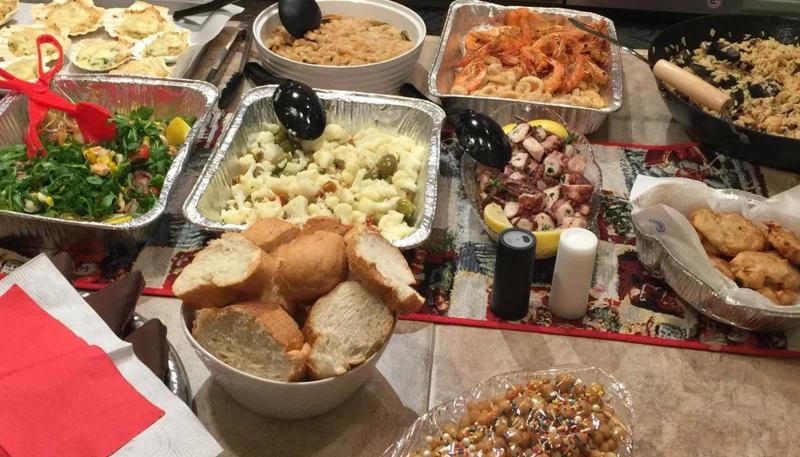 Where does the ‘Feast of the 7 Fishes’ Christmas Eve tradition come from? #Catholic 
 
 A variety of fish dishes served on Christmas Eve. / Credit: Francesca Pollio Fenton/CNA

CNA Staff, Dec 24, 2025 / 04:00 am (CNA).
There are numerous Christmas Eve traditions families around the world take part in, whether it’s watching a certain movie together, baking cookies for Santa, opening one present before going to bed, or eating a specific meal for dinner. The Feast of the Seven Fishes — in Italian “La Vigilia,” which means “The Eve” — is one of these Christmas Eve traditions.So, where does this tradition come from?This feast stems from the southern part of Italy and spans generations. Before 1861, Italy was made up of different regions. Each had its own government, however, and the southern regions were the poorest. This remained true before and after the unification of the country. The new unified government allocated many of its resources to northern Italy, which caused poverty and organized crime in the south. The area, however, though poor, was plentiful in fish since it was so close to the ocean. The Feast of the Seven Fishes tradition is also tied to the Catholic Church’s practice of not eating meat during certain times of the year — for example, on Fridays during Lent and on the eve of some holidays. The number seven is also symbolic in that it is repeated more than 700 times in the Bible, and in Catholicism there are seven sacraments, seven days of creation, and seven deadly sins. Although it is not an actual feast day on the Catholic liturgical calendar, it is definitely a feast in terms of the amount of food on the table!A traditional pasta dish served on Christmas Eve for the Feast of the Seven Fishes. Credit: Francesca Pollio Fenton/CNAPut all these things together and that is how the Feast of the Seven Fishes began in the 1900s. Additionally, many Italians who fled the country due to poverty and immigrated to the United States brought this tradition with them, so the feast continued among many Italian Americans.So what is eaten during this seven-course meal?While there is no specific menu, there are some guidelines that are followed. The first being, of course, having seven different fish dishes. These dishes can include any type of seafood including shellfish. Based on the fish you plan to prepare, you can then determine the different courses that typically include appetizers, a soup, pasta, a side salad, and the main entrees.Many families may also include a palette cleanser, or a small fruit dish, before bringing out the highly-anticipated desserts!Some dishes include “insalata di mare” (“ocean salad”), which typically has shrimp and mussels; “insalata di polipo” (“salad with octopus”); “capestante,” which are clam shells filled with salmon, shrimp, and bechamel sauce; “linguine con frutti di mare,” which is a pasta with several different kinds of fish; and other dishes that include fried fish, eel, crab, and lobster.”Struffoli,” a traditional Neapolitan dessert eaten on Christmas Eve. Credit: Francesca Pollio Fenton/CNAAnd we can’t forget dessert! “Struffoli” are little balls of fried dough covered in honey and sprinkles and are considered a Neapolitan dessert. Others include “mostaccioli” and “roccocò,” which are types of cookies, and “pandoro” and “panettone” are sweet breads.This is just a glimpse into the variety of dishes southern Italian families will spend hours preparing ahead of Christmas Eve dinner. Each family has its own fish dishes and ways of cooking them; however, one thing is for sure: You can expect to be filled to the brim with delicious food before heading off to bed.This story was first published Dec. 23, 2022, and has been updated.