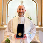 Chatham Township priest receives prestigious dissertation award in Rome #Catholic – On Nov. 21 in Rome, Father James Platania, a priest of the Paterson Diocese in New Jersey, received the Bellarmine Award at the Pontifical Gregorian University. The award is the university’s highest distinction for doctoral research and is granted each year to one dissertation judged to make an exceptional contribution to theological scholarship.
Father Platania, S.S.L., S.Th.D., serves as parochial vicar at Corpus Christi Parish in Chatham Township, N.J., teaches at Seton Hall University in South Orange, N.J., and serves as Catholic chaplain to the New York Giants.
The award was bestowed by Jesuit Father Mark Lewis, rector of the university, during a formal ceremony held in conjunction with a meeting of rectors from Jesuit universities across Europe. Named for Robert Bellarmine, Doctor of the Church and a major figure in the Catholic intellectual tradition, the award honors work that exemplifies rigorous scholarship in the service of the Church’s intellectual mission.

Click here to subscribe to our weekly newsletter.

Father Platania received the award for his doctoral dissertation, completed in 2024, which examines the emergence of Shabbat in the book of Exodus. The research challenges the common assumption that this central biblical practice is instituted either in God’s rest at creation or solely in the law given at Mount Sinai. Instead, it argues that Shabbat first takes shape in the wilderness as a lived practice, discovered as the people learn to trust in God’s daily provision. Through a close narrative analysis of Exodus 16, the work highlights Moses as a faithful interpreter who helps the people discern meaning in God’s actions and respond with concrete practices of trust and obedience.
The conferral of the Bellarmine Award in Rome, within the context of an international gathering of Jesuit academic leaders, underscores the vitality of contemporary Catholic biblical scholarship and its enduring commitment to faith seeking understanding.