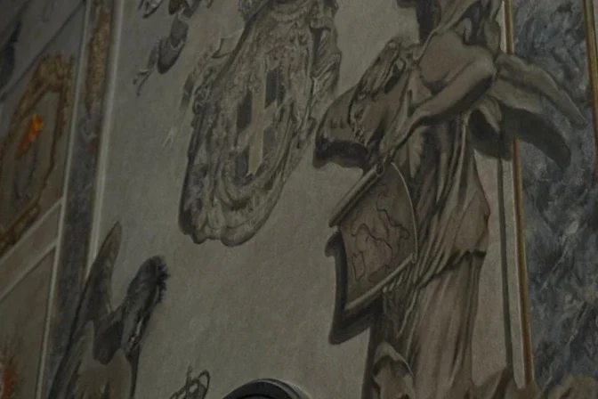 Church fresco angel that resembled Italian prime minister painted over to end controversy – #Catholic – The recent restoration of a fresco in an ancient baroque church in central Rome, just a short distance from the Spanish consulate and the Italian Parliament, has sparked an unexpected controversy after one of the angels depicted in the restoration bore a striking resemblance to Italian Prime Minister Giorgia Meloni.The figure in question holds a scroll with a map of Italy and is one of a pair of angels flanking the marble bust of Umberto II, the last king of Italy, who reigned briefly in 1946. The funerary monument includes the inscription “Acting like a Christian, resigned to the divine will.”TweetThe fresco is located in a side chapel of St. Lawrence Basilica in the Lucina area of Rome, which was built in the fourth century. In recent days, the cherub with features similar to those of Meloni became the focus of unexpected attention from numerous visitors, many of whom came out of curiosity rather than for religious reasons.
 
 Curious onlookers photograph the fresco of the angel that bore a striking resemblance to Italian Prime Minister Giorgia Meloni’s face. | Credit: Victoria Cardiel/EWTN News
 
 The Italian prime minister herself reacted with irony on social media. In a message posted on Instagram, accompanied by a smiling emoji, she wrote: “No, I certainly don’t look like an angel.”Instagram postThe image unleashed a flood of memes on the internet, where Meloni was even depicted as a version of the Mona Lisa.However, the fresco is not an ancient work of art but a relatively recent one: It was painted in 2000 as part of the funerary complex dedicated to Umberto II, installed in 1985 at the initiative of the then-parish priest, Pietro Pintus. Over the years, the painting had deteriorated and required restoration.The person responsible for the restoration was the church’s sacristan, Bruno Valentinetti, 83, who described himself to the Italian media as an amateur painter. Valentinetti insisted that he never intended to portray the prime minister and downplayed the resemblance, attributing it to a coincidence.On Jan. 31, the parish priest, Father Daniele Micheletti, was one of the first to speak publicly about the matter.Although he acknowledged the resemblance between the angel and the Italian leader, he initially downplayed the controversy. However, a few hours later, Cardinal Baldassare Reina, vicar of the Diocese of Rome, intervened, distancing himself from those remarks in an official statement.The cardinal expressed his “deep dismay” over what had happened and announced immediate measures. “It is firmly reiterated that images of sacred art and Christian tradition cannot be subject to improper use or instrumentalization, as they are intended exclusively to support liturgical life and personal and communal prayer,” he stated.Meanwhile, the church had been transformed into an impromptu tourist attraction, with dozens of people flocking there every day to see and photograph the angel, often for nonreligious reasons — without attending Mass or participating in prayer.The controversy finally came to an end on the evening of Tuesday, Feb. 3, when according to Italian newspapers, the restorer himself covered over the angel’s face with a layer of white paint. Micheletti later explained that the decision was made because the image had become divisive and because “there was a continuous stream of people coming in just to see it, not to pray or attend Mass; it was impossible to go on like this.”This story was first published by ACI Prensa, the Spanish-language sister service of EWTN News. It has been translated and adapted by EWTN News English.