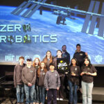 Pope John Zero Robotics place fourth in World Finals #Catholic – The Zero Robotics Team Kühlschrank of Pope John XXIII Regional High School from Sparta, N.J., placed fourth in the world finals competition at the Massachusetts Institute of Technology (MIT) in Cambridge, Mass., on Feb. 21.
Ninety-one teams from 17 countries applied to participate in the zero-gravity programming competition sponsored by MIT and NASA. The program centers on small robotic satellites called Astrobees aboard the International Space Station, which can be programmed to perform tasks in microgravity.
According to the official Zero Robotics website, the competing teams of high school students must “Write code to control satellite speed, rotation, and direction” and “navigate obstacles, collect virtual objects, and manage resources like fuel and power.” Then MIT will “Test strategies in a simulation environment that mimics real satellites,” as successful teams “advance through virtual rounds to earn a spot in the finals.” Finally, the code of the finalist alliances is run head-to-head using drones to determine which solutions are most effective, and declare a winner.

Click here to subscribe to our weekly newsletter.

The purpose of this year’s competition was to simulate greenhouse farming in space using the Astrobees. It is an initiative NASA is exploring to enable astronauts to have access to fresh produce in the harsh conditions of space.
Using carefully crafted strategy and programming, Team Kühlschrank planted, watered, and harvested crops within a 4-minute window, optimizing resource use and meeting time constraints for the best possible outcome. It successfully harvested more produce and earned more points than most of the competing teams, earning its place in the semi-finals. They were then defeated by the second-place alliance, finishing fourth.
“I am extremely proud of the team’s hard work and dedication that they showed throughout the competition,” said Joseph Giovannone, coach of Pope John Zero Robotics and head of the Pope John math department. “Many of the students were new to Zero Robotics this year, but their ability and willingness to work together to strategize and solve a challenging problem contributed greatly to their success. I am very excited to see what the team is capable of next year now that they have had this valuable experience.”
Team Kühlschrank was established in 2011, in the early years of Pope John’s Zero Robotics program, and has had success in competition finals many times since.
The 2026 team is comprised of 8th-12th-grade students. Assisting Giovannone are alum team members Suraj Bose, Evan Rizzo, and Michael Pacholarz.
Team Kühlschrank members are Mia Rizzo, Ak Burke, John Lubchansky, Maci Gnecco, Artem Taylor, Rylan Chintada, Diana Renninger, Chance Cosenza-Schaming, Adrian Oozeerally, William Franco, and Matthew Gazzillo.