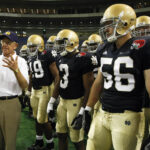 Beloved Notre Dame coaching legend Lou Holtz remembered for ‘building men, not just players’ #Catholic – (OSV News) — Leading up to a college football clash between Notre Dame and heated rival Miami in the late 1980s, a team chaplain for the Hurricanes proclaimed that God doesn’t care who wins football games.
Lou Holtz, coach of the Fighting Irish at the time, agreed. “I don’t think God cares who wins, either,” he replied with a smile. “But his Mother does.”
This now-famous quip captured the essence of the legendary coach: an uncanny wit, an unwavering Catholic faith and an unshakable love for Notre Dame — Our Lady’s university. On March 4, Holtz died in Orlando, Florida, at the age of 89, surrounded by his family. Forever etched in Fighting Irish lore for leading Notre Dame to the 1988 National Championship, Holtz leaves behind not just a decorated football resume but a legacy of shaping young men and inspiring people to live virtuously.
“Notre Dame mourns the loss of Lou Holtz, a legendary football coach, a beloved member of the Notre Dame family, and devoted husband, father, and grandfather,” said Holy Cross Father Robert A. Dowd, Notre Dame’s president, in a public statement. “Among his many accomplishments, we will remember him above all as a teacher, leader, and mentor who brought out the very best in his players, on and off the field, earning their respect and admiration for a lifetime.”

Click here to subscribe to our weekly newsletter.

Louis Leo Holtz was born on Jan. 6, 1937, in Follansbee, West Virginia, and grew up in East Liverpool, Ohio. He played linebacker at Kent State University before beginning a coaching career that would span over four decades. With head coaching stops at William and Mary, North Carolina State, Arkansas, Minnesota, Notre Dame and South Carolina, Holtz became the ninth-winningest coach in college football history with a record of 249-132-7. He received national Coach of the Year honors on three occasions and remains the only coach to lead six separate programs to bowl games.
However, Holtz is best remembered for his 11 seasons in South Bend, where he revitalized the Notre Dame football program. From 1986 through 1996, the Fighting Irish won 100 games, reached a program-record nine consecutive bowl games, and were undefeated national champions in 1988 — Notre Dame’s last national title to date.
As coach of the Irish, Holtz was humble but confident, respectful but fearless, and wise but candid. He established several traditions at Notre Dame that remain in place today, from the iconic “Play Like a Champion” sign that players slap on their way to the field, to the removal of names from the football jerseys to emphasize the team dynamic. The mark Holtz left on the program, the university and especially the young men who played for him cannot be overstated.
“Lou and I shared a very special relationship,” Notre Dame Head Coach Marcus Freeman said in a statement. “He welcomed me to the Notre Dame family immediately, offering me great support throughout our time together. Our relationship meant a lot to me as I admired the values he used to build the foundation of his coaching career: love, trust, and commitment. Lou’s impact at Notre Dame has gone well beyond the football team. He and his wife, Beth, are respected across campus for their generous hearts and commitment to carrying out Notre Dame’s mission of being a force for good.”
Former Irish great Jerome Bettis shared on social media that Holz “believed in building men, not just players.”
“Coach was so much more than a football coach to me. He was family,” Bettis, a fullback for the Irish from 1990-1993, posted March 4. “I still remember the day he came to my house to recruit me. He didn’t just sit down and talk to me about football or what I could do on the field. He talked to me as a young man. And he spoke to my mom the way a man should speak to a mother who was trusting someone with her son. He looked her in the eye and promised that I would be taken care of at Notre Dame. That moment meant everything to us, and it’s something I’ve carried with me my entire life.”
After retiring from coaching, Holtz spent time as a studio analyst for ESPN, a best-selling author and a motivational speaker, where he continued inspiring people with the same energy and charisma.
He often told crowds, “I follow three rules: Do the right thing, do the best you can, and always show people you care.” Holtz preached that “life is 10 percent what happens to you and 90 percent how you respond to it.” He challenged people to live exceptional lives, famously stating, “I can’t believe that God put us on this earth to be ordinary.”
Central to everything Holtz did was his faith. A lifelong Catholic, Holtz served as an altar boy and credited the education he received from the Sisters of Notre Dame with instilling the desire to make God the focus of his life. Holtz was outspoken about his faith and believed following Church teachings “brings meaning and lasting happiness to life.”
He possessed a deep and profound love for Notre Dame — not just his team, but the university, the students, the fans and the faith alive on campus. “Every single day being there was very special,” Holtz told the National Catholic Register in a 2012 interview, “because there were so many opportunities to encounter and live out the Catholic faith.”
The late Bishop John M. D’Arcy of the Diocese of Fort Wayne-South Bend once asked Holtz what it meant to be the head football coach at Notre Dame. His answer displayed a life not consumed by his career but anchored by his Catholic faith. “It means if you have an 8 o’clock meeting, you can find a 7 o’clock Mass,” Holtz responded. “When you want to go to confession, you just walk across the campus to the basilica. When you are leaving at 10 o’clock at night, the Lady on the dome is smiling down at you.”
Holtz reaffirmed his love for Our Lady after coaching his final game at Notre Dame Stadium. After his final home game, when asked by a Fort Wayne News-Sentinel columnist how he’ll be remembered, a tearful Holtz said, “I never disgraced the Lady on the dome.” Holtz was a living embodiment of the final line of the university’s alma mater song, “Notre Dame, Our Mother,” that marks the end of each sporting event: “And our hearts forever love thee, Notre Dame!”
Holtz is survived by his four children, Luanne, Lou “Skip” Jr., Kevin and Elizabeth. His family is finalizing funeral arrangements, including a Mass of Christian Burial at the Basilica of the Sacred Heart at Notre Dame. Holtz will be laid to rest at Notre Dame’s Cedar Grove Cemetery next to his wife, Beth.
Eric Peat writes from Fort Wayne, Indiana, for Today’s Catholic, the news outlet of the Diocese of Fort Wayne-South Bend. This story was originally published by Today’s Catholic and distributed through a partnership with OSV News.
&nbsp;