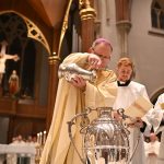 Sacred oils to be consecrated at Paterson Chrism Mass #Catholic – All the faithful of the Paterson Diocese in New Jersey are invited to join Bishop Kevin J. Sweeney for the Chrism Mass on Tuesday, March 31, at 7 p.m. in the Cathedral of St. John the Baptist in Paterson, N.J. All the priests of the diocese attend the annual Mass for the blessing of coming together in spiritual fellowship with Bishop Sweeney.
During the Mass, Bishop Sweeney will consecrate and bless the Oil of the Sick, used in the Anointing of the Sick, and the Oil of Catechumens, used for anointing those preparing for baptism. He will also consecrate the Sacred Chrism, used for baptism, confirmation, holy orders, and the dedication of altars. These holy oils will be used in parishes throughout the diocese during the coming year for various sacramental celebrations.

Click here to subscribe to our weekly newsletter.

Bishop Sweeney will be the homilist and principal celebrant of the Mass, with the priests of the diocese in attendance, concelebrating. The priests will renew their priestly promises before the bishop and receive the prayers and support of the people of God. Diocesan faithful, including deacons, religious, and laity, typically attend the liturgy, which will be livestreamed.
Father Jared Brogan, diocesan director of the Office of Worship and diocesan master of ceremonies, is coordinating the Chrism Mass.
“For priests, concelebrating the Chrism Mass with the bishop and presbyterate shows our relationship with the bishop and with one another,” Father Brogan said. “It is also an opportunity to renew our priestly promises before the bishop and to be present as he blesses the holy oils to be used by priests in their parishes. There is a great sense of communion: time to reflect, be reminded of, and appreciate the gift and mystery of the priesthood. It is also a sign of communion with all the faithful at this liturgy. They witness the priesthood and are invited to pray for the priests,” he said.
After the Mass, the holy oils will be distributed to representatives from each parish in the diocese, who will use them for the first time at the Easter Vigil. Once a year, a bishop blesses holy oils in his diocese, uniting him with the parishes when the sacraments are celebrated, and the oils are used.