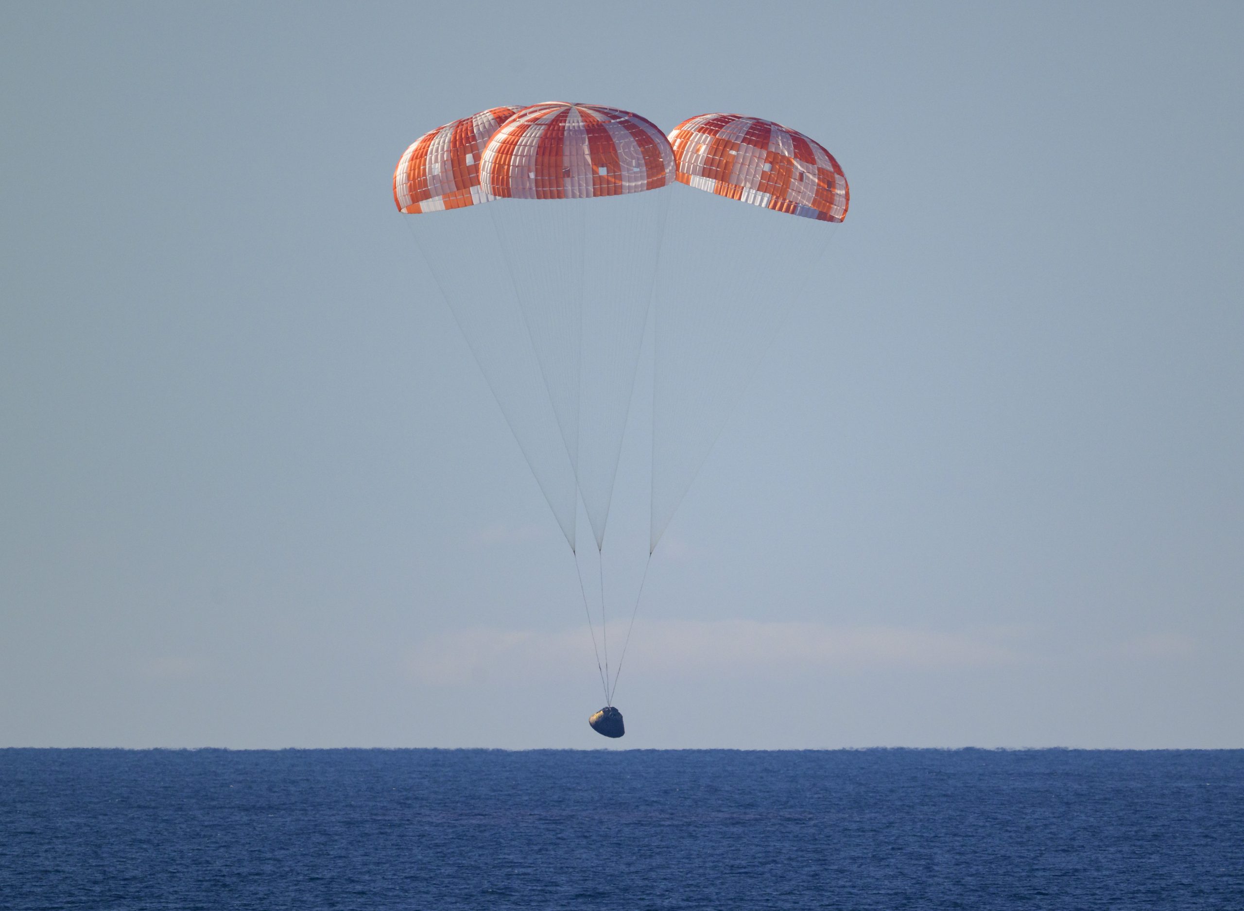 Artemis II Recovery – NASA’s Orion spacecraft with Artemis II crewmembers NASA astronauts Reid Wiseman, commander; Victor Glover, pilot; Christina Koch, mission specialist; and CSA (Canadian Space Agency) astronaut Jeremy Hansen, mission specialist aboard is seen under parachutes as it lands in the Pacific Ocean off the coast of California, Friday, April 10, 2026. NASA’s Artemis II mission took Wiseman, Glover, Koch, and Hansen on a 10-day journey around the Moon and back to Earth. Following a splashdown at 7:07 p.m. EDT, NASA, U.S. Navy, and U.S. Air Force teams are working to bring the crewmembers and Orion spacecraft aboard USS John P. Murtha. Artemis II Recovery – NASA’s Orion spacecraft with Artemis II crewmembers NASA astronauts Reid Wiseman, commander; Victor Glover, pilot; Christina Koch, mission specialist; and CSA (Canadian Space Agency) astronaut Jeremy Hansen, mission specialist aboard is seen under parachutes as it lands in the Pacific Ocean off the coast of California, Friday, April 10, 2026. NASA’s Artemis II mission took Wiseman, Glover, Koch, and Hansen on a 10-day journey around the Moon and back to Earth. Following a splashdown at 7:07 p.m. EDT, NASA, U.S. Navy, and U.S. Air Force teams are working to bring the crewmembers and Orion spacecraft aboard USS John P. Murtha.