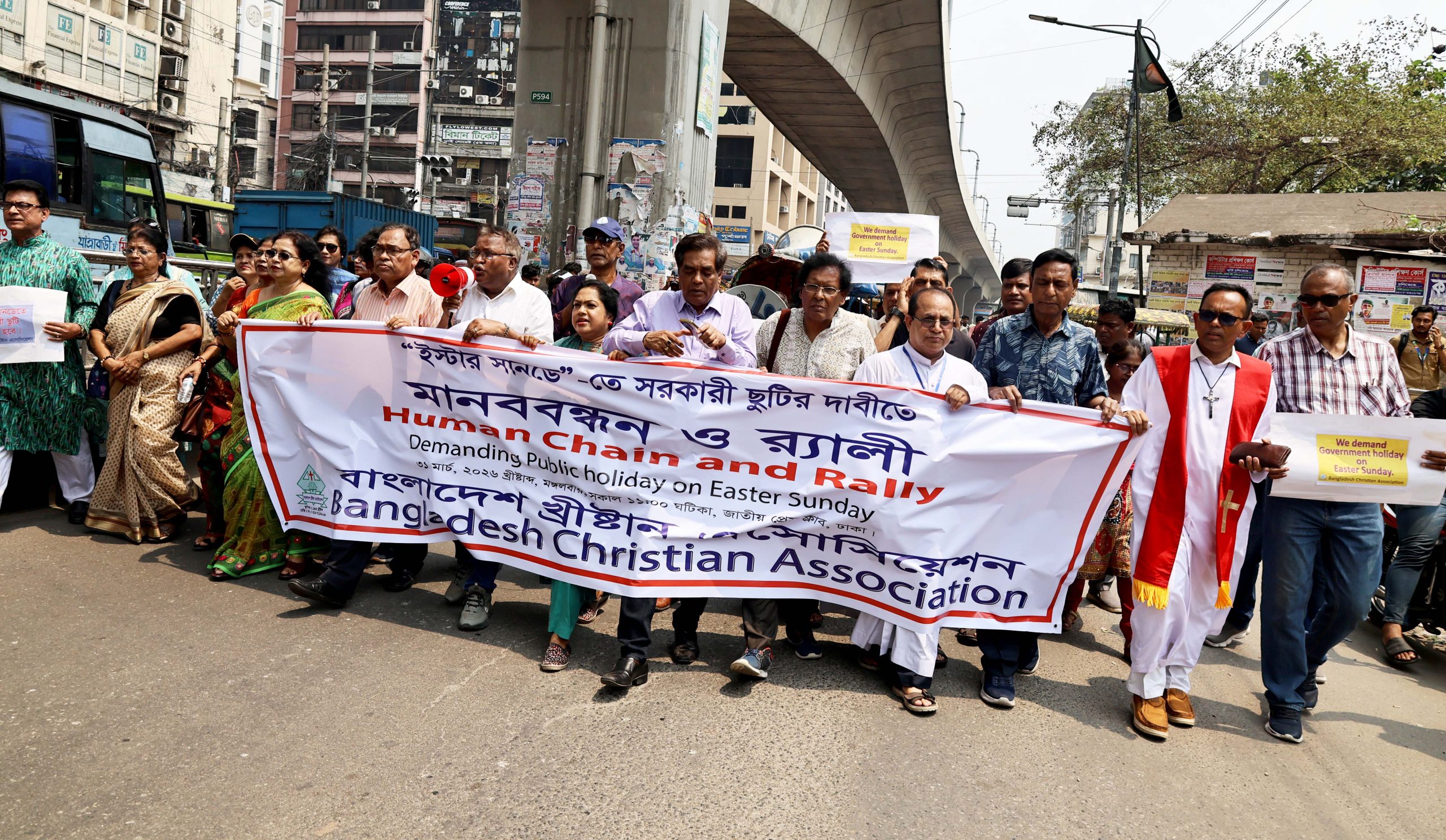 Bangladesh Christians form human chain demanding Easter public holiday #Catholic DHAKA, Bangladesh — Christians in Bangladesh formed a human chain and rally in the capital March 31 demanding that the government declare Easter Sunday a public holiday.The Bangladesh Christian Association organized the demonstration in front of the National Press Club in Dhaka, calling on Prime Minister Tarique Rahman to add Easter to the government’s official holiday calendar.Easter Sunday falls on April 5 this year. Bangladesh’s roughly 600,000 Christians — less than 1% of the country’s approximately 170 million people — currently receive only one public holiday for a Christian feast: Christmas Day.Catholic bishops support the demandThe Catholic Church in Bangladesh has also voiced support for the campaign.Archbishop Bejoy N. D’Cruze, OMI, of Dhaka, president of the Catholic Bishops’ Conference of Bangladesh, expressed his solidarity with the demand for a holiday on Easter in an interview with EWTN News on March 30.“Since we do not have a government holiday on Easter Sunday, we cannot all celebrate this day together. Many cannot go to the villages, and we cannot all observe the religious customs that are in place before Easter,” D’Cruze told EWTN News.“I also demand from the government to declare a public holiday on Easter so that we Christians can celebrate the resurrection of Jesus Christ together in family, social, and religious ways,” the archbishop added.‘A heavy heart’Bangladesh Christian Association President Nirmal Rozario said the demand for the holiday is long-standing.“We have come here with a heavy heart and are standing in front of the Press Club. Easter Sunday is very important to us after Christmas. Jesus is the only person in the history of the world who has risen after death. We are demanding a public holiday on this important and significant day, Easter Sunday,” Rozario said.He added that the Christian community “has made considerable contributions to the formation of Bangladesh” in the areas of education, health services, and development, and questioned why the government has not granted the holiday.Rozario called on Rahman to add Easter Sunday to the government holiday calendar beginning next year and to grant a holiday for this year through an executive order.Unequal holiday allocationsMuslims, who make up roughly 91% of the population according to the 2022 census, receive multiple public holidays for their major religious celebrations, including several days for Eid al-Fitr and Eid al-Adha. Hindus, who constitute about 8% of the population, have two days off for their main religious festival, Durga Puja.Christians, however, have only one public holiday — Christmas Day.Manju Maria Palma, secretary of The Christian Cooperative Credit Union Ltd. in Dhaka, a 48,000-member organization, was present at the human chain.“Christ was resurrected on this day. This day is very important. If this public holiday is given, not only the Christian community will benefit but also our brothers and sisters of other religions will understand the significance of this day,” Palma said.Lawmaker expresses hopeEWTN News contacted at least three members of Parliament, including Abdul Aziz, a member of Parliament from the Natore-4 constituency, which includes a historic Christian settlement.Aziz told EWTN News: “Since we respect all religious ceremonies, including Christian activities, and since Christians have expressed their demands, our government will definitely consider the matter.”He also expressed hope that the government will soon discuss the issue of a holiday on Easter Sunday.