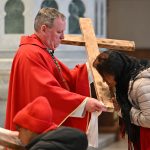 Cathedral hosts powerful commemoration of Lord’s Passion and death #Catholic - Bishop Kevin J. Sweeney led the Paterson Diocese in New Jersey in commemorating Christ’s sacrifice on the cross on Good Friday, April 3, as he presided over the Celebration of the Lord’s Passion at the Cathedral of St. John the Baptist in Paterson, N.J. Before the at 3 p.m. services, the Via Crucis, a reenactment of the Passion of Christ, took place in the cathedral and through the streets in Paterson.
During the service, a Passion story from the Gospel of John was read, and 10 solemn intercessions were offered. To show reverence during the solemn service, clergy, lay ministers, and the faithful genuflected before or kissed the cross, and the clergy prostrated themselves before the altar or kneeled and prayed in silence. Then, Holy Communion was distributed. St. John’s altar was stripped bare without cloth, candles, or a cross.

Click here to subscribe to our weekly newsletter.

No Masses are celebrated on Good Friday, a day of fasting and abstinence.
Msgr. Geno Sylva, the cathedral’s rector and diocesan vicar for special projects; Father Starli J. Castanos, a St. John’s parochial vicar; and the deacons of the cathedral joined Bishop Sweeney in participating in the Celebration of the Lord’s Passion.
BEACON PHOTOS | JOE GIGLI
 [See image gallery at beaconnj.org] &nbsp;
&nbsp;