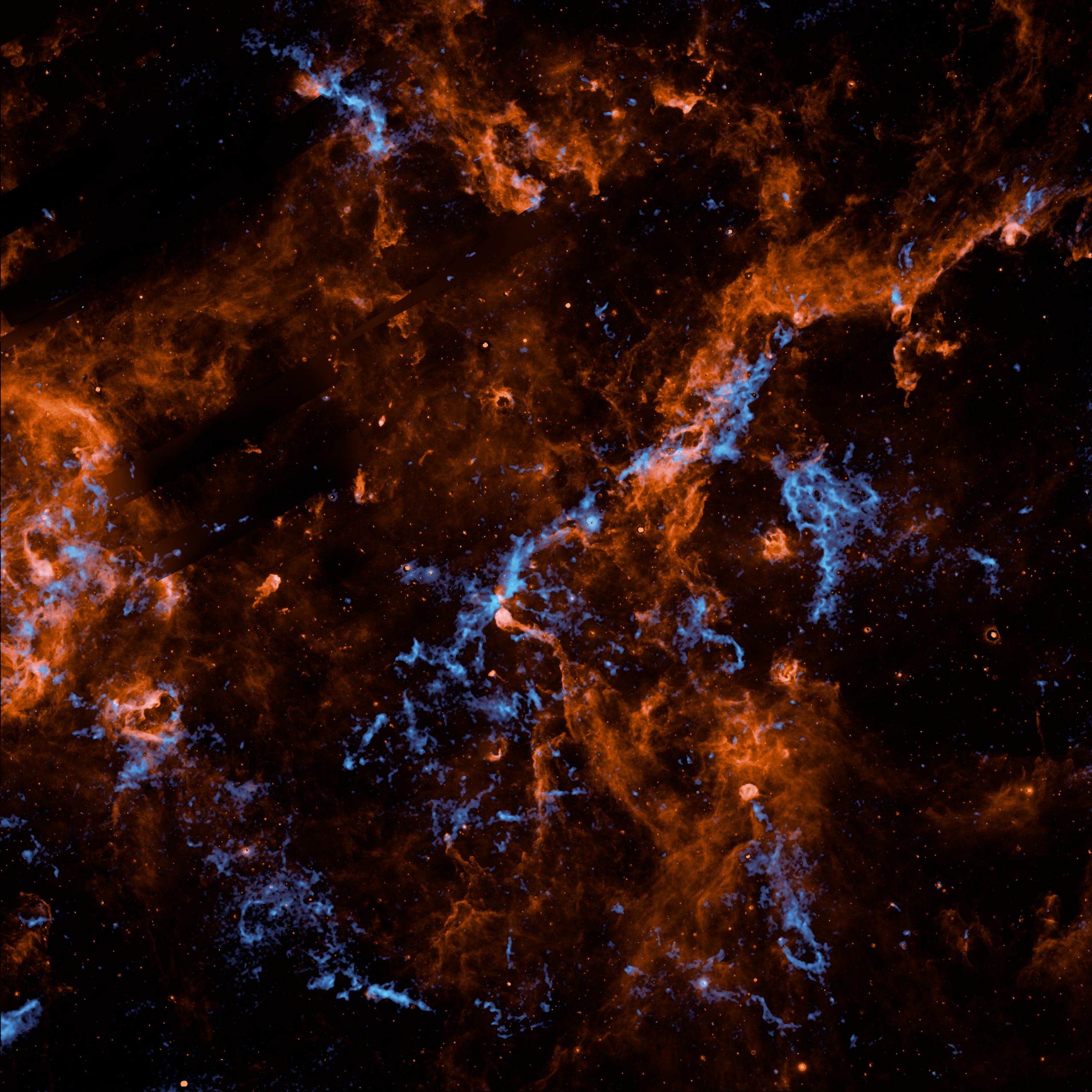 NASA’s SPHEREx Observatory Maps Interstellar Ice in Milky Way – An observation made by NASA’s SPHEREx mission reveals vast frozen complexes in the Cygnus X star-forming region of the Milky Way galaxy. The chemical signature of water ice is shown as bright blue structures, while polycyclic aromatic hydrocarbons are in orange.