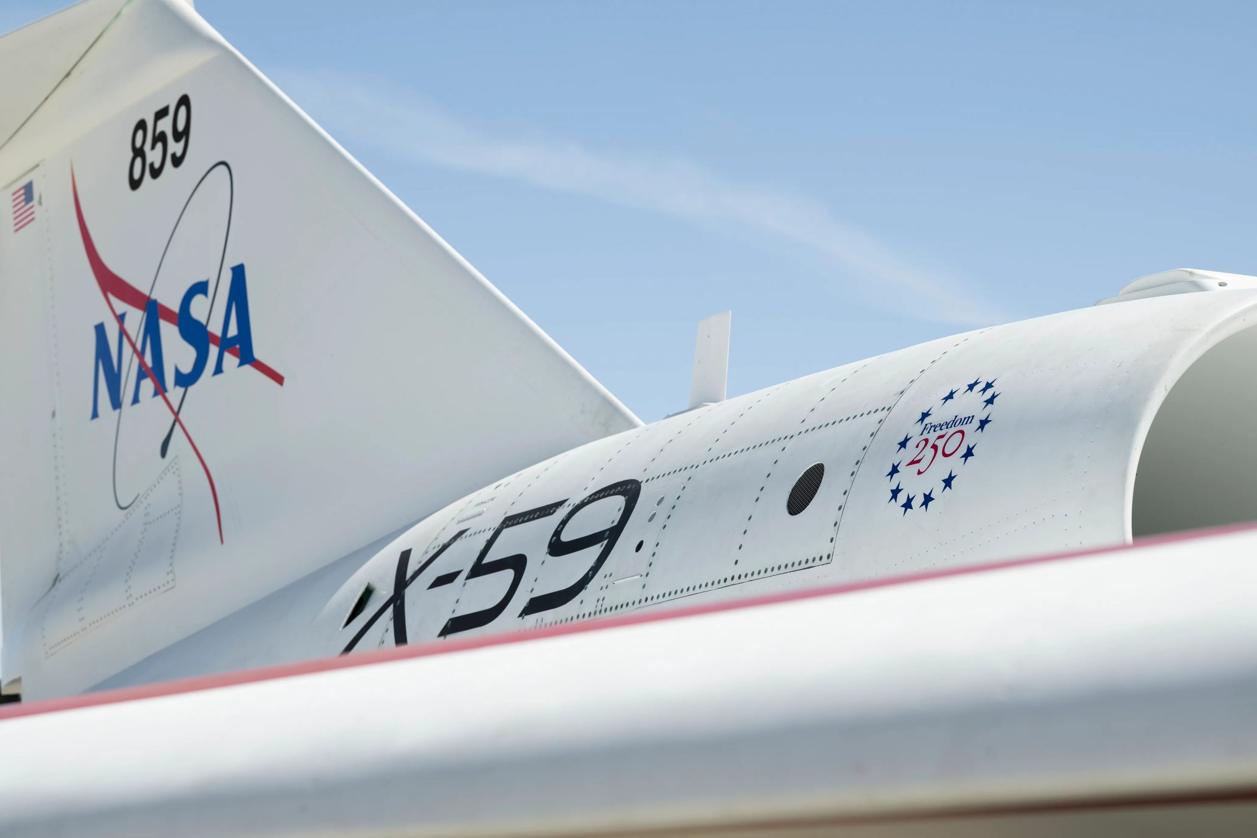 NASA’s X-59 Gets Freedom 250 Logo – The X-59’s tail and jet engine feature a new marking — a Freedom 250 logo celebrating the nation’s 250th birthday in 2026.