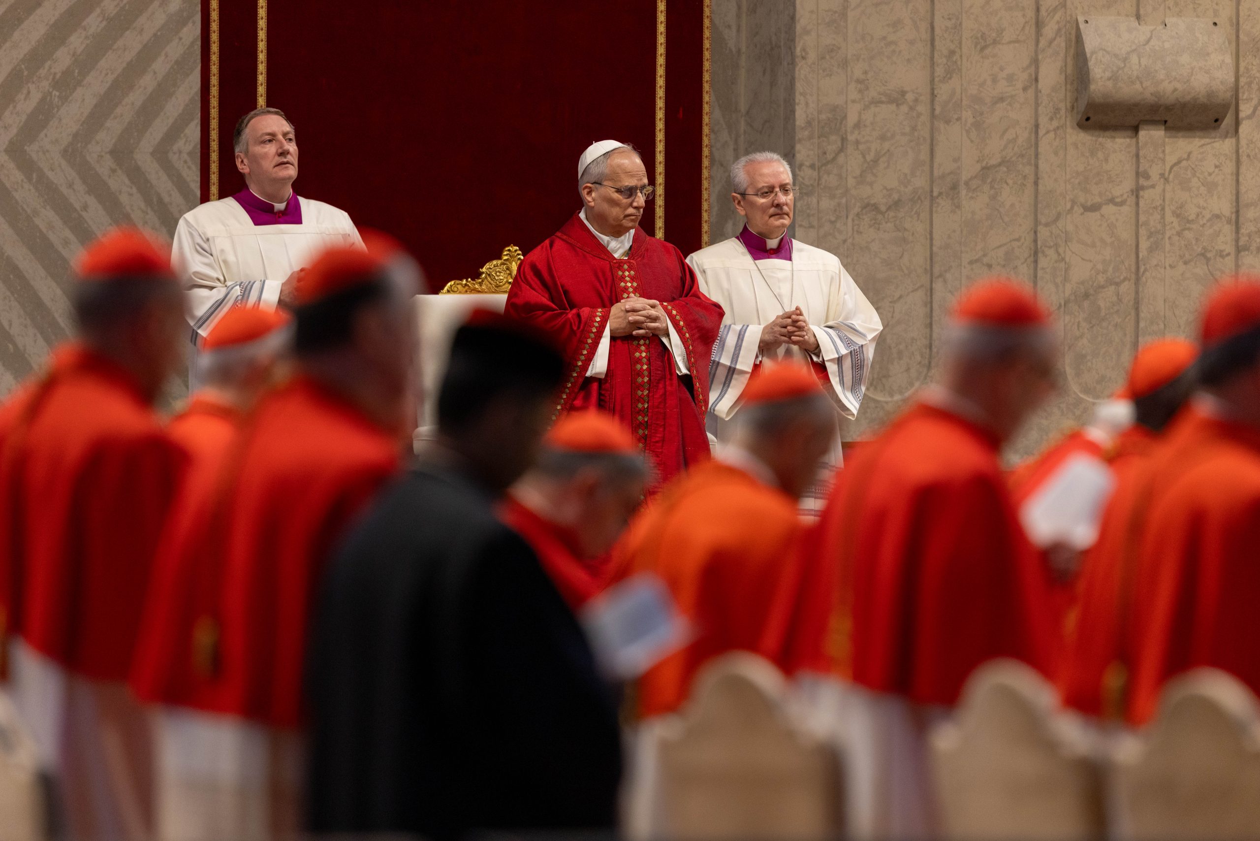Pope Leo XIV celebrates Good Friday of the Lord’s Passion in St. Peter’s Basilica - #Catholic - VATICAN — Pope Leo XIV presided over the Celebration of the Lord’s Passion in St. Peter’s Basilica on Good Friday during which the preacher of the papal household exhorted Christians to “approach the Lord’s cross without fear.”The liturgy began with the pope lying prostrate before the cross and then unfolded in three parts: the Liturgy of the Word, veneration of the cross, and Holy Communion.There was no opening antiphon; the solemn liturgy began with silent prayer, the unifying thread through the entire celebration.After the proclamation of the Gospel of John’s account of Christ’s passion, the papal preacher, Father Roberto Pasolini, OFMCap, delivered a homily.
 
 Pope Leo XIV lies prostrate before the altar in St. Peter’s Basilica during the Liturgy of the Lord’s Passion, Friday, April 3, 2026. | Credit: Daniel Ibáñez/EWTN News
 
 ‘The greatest act of love’“In a time like ours, still torn apart by hatred and violence, when even the name of God is invoked to justify wars and deadly decisions, we Christians are called to approach the Lord’s Cross without fear — indeed, with full trust — knowing that it is a throne upon which one sits and learns to reign with him by placing one’s life at the service of others,” Pasolini said.“If we can hold fast to the profession of this faith, then our days too will be able to give voice to the songs of both joy and suffering, that mysterious score of the Cross in which the notes of the greatest love can be clearly recognized,” he continued.The preacher recalled that the day’s liturgy invites Catholics to contemplate the Passion: “Yet the Cross of Christ risks remaining incomprehensible if we look at it only as an isolated fact, as a sudden event. In reality, it is the highest point of a journey, the fulfillment of an entire life in which Jesus learned to listen to and welcome the voice of the Father, allowing himself to be guided day by day all the way to the greatest act of love.”“Jesus is the man of sorrows who knows suffering well — no violence, no resort to force, no temptation to destroy everything and start over from scratch. We know how difficult it is to embrace such a mission. We are tempted to use aggression and violence, thinking that without them nothing can ever be resolved. But only meekness is the true strength for confronting the darkness of evil,” he continued.
 
 Father Roberto Pasolini preaches during the Liturgy of the Lord’s Passion in St. Peter’s Basilica, Friday, April 3, 2026. | Credit: Daniel Ibáñez/EWTN News
 
 Example of the Servant SongsIn his homily, Pasolini referred to the Servant Songs, four poetic texts found in the Book of the Prophet Isaiah (42, 49, 50, 52–53), which describe a mysterious figure — the “Servant”— who fulfills God’s will through vicarious suffering.“To understand this journey during the days of Holy Week, the liturgy has had us listen to the so‑called Songs of the Servant of the Lord. These are poetic texts in which the prophet Isaiah sketched the figure of a mysterious servant through whom God would be able to save the world from evil and sin. Christian tradition has recognized in these songs a striking and dramatic foreshadowing,” Pasolini explained.“In the third song, a new surprise emerges: The servant wants to help, but people respond with anger and violence,” Pasolini said. “Those who live in darkness do not always welcome the light, because the light also exposes what we would prefer to keep hidden — our wounds, our ambiguities.”“In the fourth song, something deeply unsettling occurs: The violence inflicted on the servant is so intense that it disfigures his face. He has no appearance or beauty, yet the servant has learned not to return the evil he has received,” the preacher said.The servant "does not resign himself to this logic [of violence]; he absorbs everything without retaliating. For this reason, he bore the sin of many,” the priest explained.For the papal preacher, the Lord Jesus “did not merely listen to these songs; he lived them intensely, with complete trust in the Father.”“We see it constantly in wars, in divisions, in wounds: evil keeps circulating because it always finds someone willing to pass it on. Jesus broke this chain by accepting what happened to him. In the Passion, he recognized the score of the songs of love and service that the Father had entrusted to him. In this way, he learned the most difficult obedience — the obedience of loving the other,” Pasolini continued.“The voice of God no longer guides us — not because it has disappeared, but because it has become just one voice among many, the others promising security and well‑being,” he said.“What is missing is a word, a song capable of guiding our steps toward a more just world,” he added. “And yet, if we look closely, we can glimpse a silent crowd of people who choose a different voice — a voice that does not shout, that does not impose itself by force, a quiet and persistent song that invites us to love and never return evil for evil. They do not perform extraordinary deeds, but each day they try to make their lives serve not only themselves, but others as well.”
 
 Pope Leo XIV prays in St. Peter’s Basilica during the Liturgy of the Lord’s Passion, Friday, April 3, 2026. | Credit: Daniel Ibáñez/EWTN News
 
 ‘Lay down the weapons’Referencing the act of venerating the cross, Pasolini encouraged those present to use the opportunity to “lay down the weapons” they are holding.“They may not seem as dangerous as those wielded by the powerful of this world. Yet they, too, are instruments of death, because they are enough to weaken, wound, and drain meaning and love from our daily relationships,” he said.“Salvation will not drop down from above, nor can it be guaranteed by political, economic, or military decisions. The world is constantly being saved by those who are willing to embrace the Songs of the Servant of the Lord as the shape of their own lives,” the preacher encouraged. “This is what the Lord Jesus did. He took the Father’s will seriously, accepting it as a score to be carried out to the end, with loud cries and tears.”“Tonight we too are handed the score of the cross. We can freely accept it if we acknowledge that there is no difficulty that cannot be faced, no guilty party we must point to, no enemy who can prevent us from loving and serving.""There is only ourselves — who, by choosing not to return evil, by remaining patient in trials, by believing in good even when darkness seems to swallow everything, can become day by day those servants the Lord needs to bring salvation into the world,” he said.This story was originally published by ACI Stampa, EWTN News' Italian-language partner agency. It has been translated and adapted by EWTN News English.