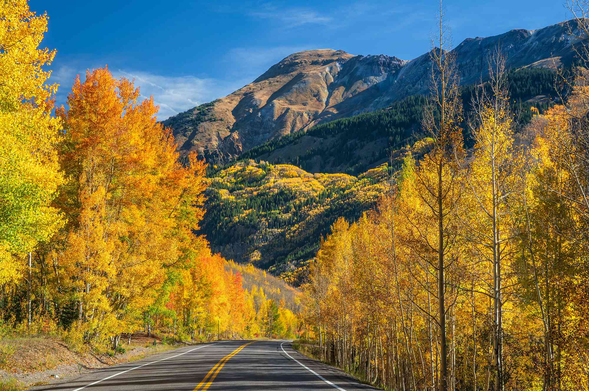 This 25-mile Road Trip for Daredevils Is One of the Most Scenic in the U.S.—With No Guardrails, Sheer Drop-offs, and Stunning Canyon Views #Travel The Million Dollar Highway winds through cliffs, canyons, and 14,000-foot peaks.