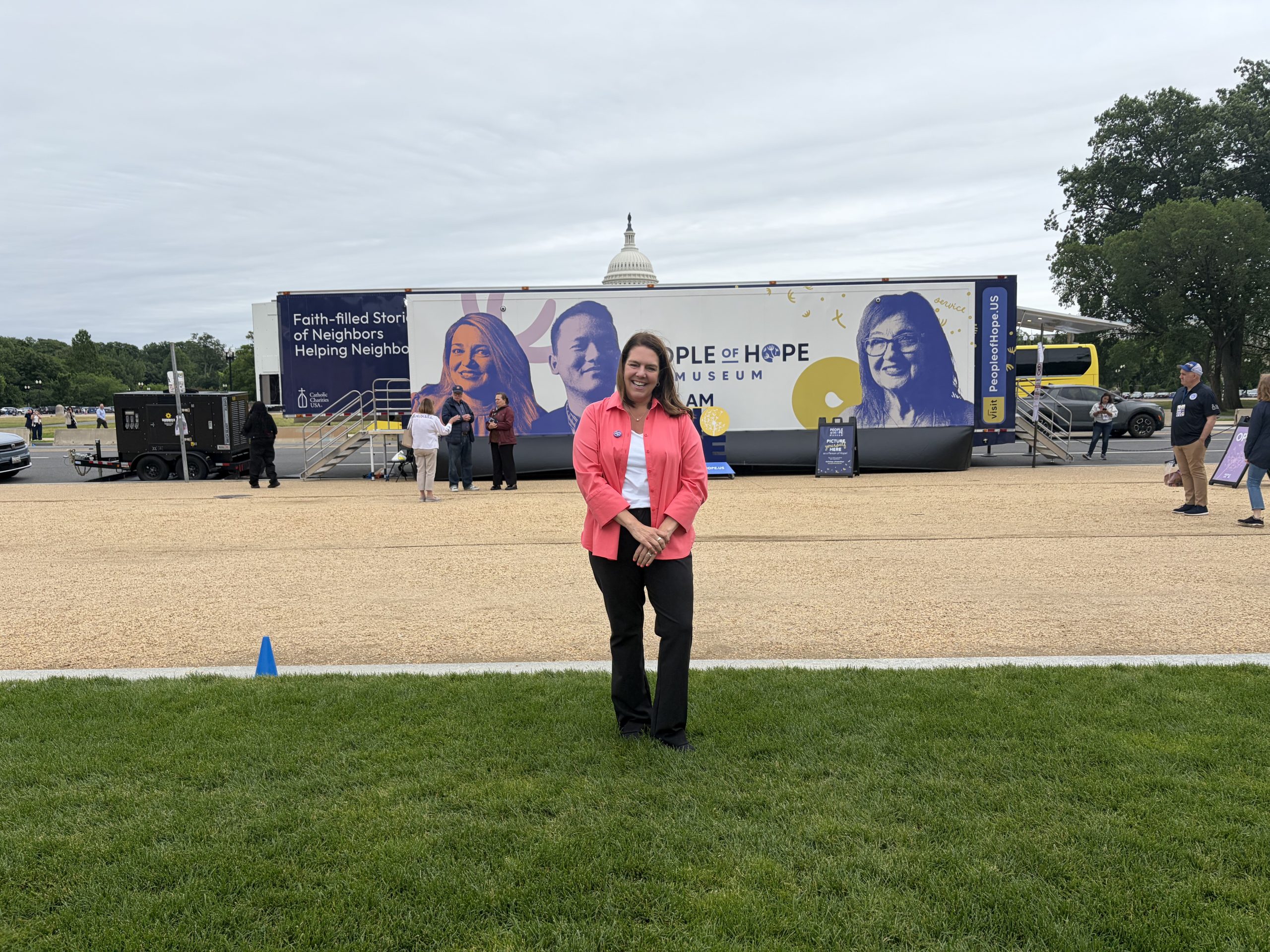 Catholic Charities USA brings traveling exhibit to U.S. Capitol on annual lobbying day – #Catholic – Catholic Charities USA brought its traveling “People of Hope Museum” to Capitol Hill for its annual advocacy day, inviting members of Congress to see firsthand how its ministries impact both those who serve and those they serve.“We’re anxious to get them to visit this,” Luz Tavarez, vice president for government relations at Catholic Charities USA (CCUSA), told EWTN News. Tavarez was among 21 diocesan officials who participated in CCUSA’s annual “Hill Day” on May 19-20 to lobby Congress on housing, food insecurities, and other poverty-related issues.CCUSA’s mobile museum is scheduled to be parked on the National Mall in front of the Capitol through May 22.“Whatʼs really amazing about the People of Hope Museum is that itʼs a firsthand account of how we see Jesus in the people we serve,” she said. “So, I really hope that they do get down here. We have invited every single one of them to come, so weʼll see.”The group met with about 60 offices, Tavarez said, including members of the House and Senate.Four members addressed CCUSA, including Rep. Jim McGovern, D-Massachusetts, Rep. James Clyburn, D-South Carolina, Rep. Mike Lawler, R-New York, and Sen. Susan Collins, R-Maine.“All of those members challenged us to just continue to hit the ground educating members of the important work that we do,” Tavarez said. “I think thereʼs a recognition on both sides of the aisle of how critical the work that Catholic Charities around the country, the work that we do, is. But again, our goal was just really to ensure that government funding, government appropriations, is reaching the most vulnerable.”Tavarez highlighted the recently-passed farm bill and housing issues as areas where they found bipartisan support among members. She said the group did not experience much pushback but that the challenge lay in educating members “on how our Catholic faith is translated into the policy positions we take, and thatʼs just consistent on both sides of the aisle.”
Women observe data on medical debt in exhibit inside the People of Hope Museum in Washington, D.C., May 21, 2026. | Credit: Madalaine Elhabbal/EWTN News
The lobbying day came a week after Democratic senators pressed Housing and Urban Development (HUD) Secretary Scott Turner over missing data on homelessness and the Trump administration’s planned cuts to federal funding for homelessness.“Itʼs important to understand that not everyone understands the work that we do,” she said. “And for some people, Catholic Charities means just one thing, you know, perhaps itʼs working with immigrants. For other people, Catholic Charities is just the local food pantries. And there is some intersection there.”“What is beautiful about ‘Hill Day’ in my view is that Catholic Charities, of course, is not a political or partisan entity,” CCUSA CEO Kerry Alys Robinson told EWTN News. “It is a social ministry of the Church, and it encompasses the full political spectrum.”
CCUSA CEO Kerry Alys Robinson stands in front of the traveling exhibit People of Hope Museum on the National Mall in Washington, D.C., on May 21, 2026. | Credit: Madalaine Elhabbal/EWTN News
“Elected officials across the aisle all understand just how important Catholic Charities is to their constituents in their districts and in their states,” she said. “So I think judging from all reports, the meetings went very, very well, and our diocesan directors are especially happy to be here.” Catholic Charities USA brings traveling exhibit to U.S. Capitol on annual lobbying day – #Catholic – Catholic Charities USA brought its traveling “People of Hope Museum” to Capitol Hill for its annual advocacy day, inviting members of Congress to see firsthand how its ministries impact both those who serve and those they serve.“We’re anxious to get them to visit this,” Luz Tavarez, vice president for government relations at Catholic Charities USA (CCUSA), told EWTN News. Tavarez was among 21 diocesan officials who participated in CCUSA’s annual “Hill Day” on May 19-20 to lobby Congress on housing, food insecurities, and other poverty-related issues.CCUSA’s mobile museum is scheduled to be parked on the National Mall in front of the Capitol through May 22.“Whatʼs really amazing about the People of Hope Museum is that itʼs a firsthand account of how we see Jesus in the people we serve,” she said. “So, I really hope that they do get down here. We have invited every single one of them to come, so weʼll see.”The group met with about 60 offices, Tavarez said, including members of the House and Senate.Four members addressed CCUSA, including Rep. Jim McGovern, D-Massachusetts, Rep. James Clyburn, D-South Carolina, Rep. Mike Lawler, R-New York, and Sen. Susan Collins, R-Maine.“All of those members challenged us to just continue to hit the ground educating members of the important work that we do,” Tavarez said. “I think thereʼs a recognition on both sides of the aisle of how critical the work that Catholic Charities around the country, the work that we do, is. But again, our goal was just really to ensure that government funding, government appropriations, is reaching the most vulnerable.”Tavarez highlighted the recently-passed farm bill and housing issues as areas where they found bipartisan support among members. She said the group did not experience much pushback but that the challenge lay in educating members “on how our Catholic faith is translated into the policy positions we take, and thatʼs just consistent on both sides of the aisle.”
Women observe data on medical debt in exhibit inside the People of Hope Museum in Washington, D.C., May 21, 2026. | Credit: Madalaine Elhabbal/EWTN News
The lobbying day came a week after Democratic senators pressed Housing and Urban Development (HUD) Secretary Scott Turner over missing data on homelessness and the Trump administration’s planned cuts to federal funding for homelessness.“Itʼs important to understand that not everyone understands the work that we do,” she said. “And for some people, Catholic Charities means just one thing, you know, perhaps itʼs working with immigrants. For other people, Catholic Charities is just the local food pantries. And there is some intersection there.”“What is beautiful about ‘Hill Day’ in my view is that Catholic Charities, of course, is not a political or partisan entity,” CCUSA CEO Kerry Alys Robinson told EWTN News. “It is a social ministry of the Church, and it encompasses the full political spectrum.”
CCUSA CEO Kerry Alys Robinson stands in front of the traveling exhibit People of Hope Museum on the National Mall in Washington, D.C., on May 21, 2026. | Credit: Madalaine Elhabbal/EWTN News
“Elected officials across the aisle all understand just how important Catholic Charities is to their constituents in their districts and in their states,” she said. “So I think judging from all reports, the meetings went very, very well, and our diocesan directors are especially happy to be here.”