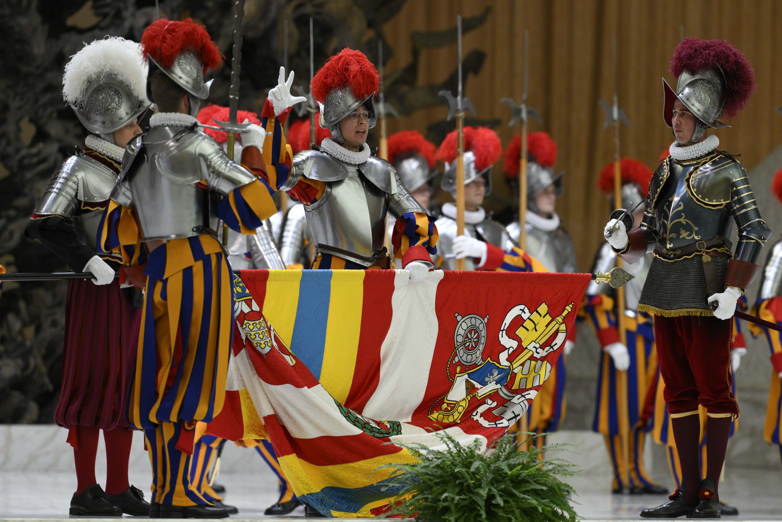 Fidelity, enthusiasm, and faith: Pope Leo XIV welcomes Swiss Guard recruits #Catholic Recruits of the Pontifical Swiss Guard took their oath of allegiance to Pope Leo XIV, solemnly pledging to serve and protect him.The ceremony took place May 6 in the Paul VI Audience Hall at the Vatican in the presence of the pontiff, members of the Holy See Diplomatic Corps, and the family and friends of the 28 recruits.At the high point of the ceremony, in a gesture laden with tradition, each recruit held the banner of the Pontifical Swiss Guard with his left hand, raised three fingers with his right, and recited the oath swearing to protect the pope, even at the cost of his life. 
 
 Each recruit holds the banner of the Pontifical Swiss Guard with his left hand, raises three fingers with his right, and recites the oath swearing to protect the pope, even at the cost of his life, on May 6, 2026. | Credit: Vatican Media
 
 This gesture, more than just an oath of allegiance, also commemorates the 147 Swiss Guards who died defending Pope Clement VII during the Sack of Rome on May 6, 1527.In his address after the ceremony, Leo thanked the recruits, describing their future service as a “commitment of fidelity, inspired by youthful enthusiasm and grounded in faith in God and love for the Church.”On Thursday, the pope held a private audience with the new Swiss Guards and their families. Leo took this occasion to remind them of the beauty of their calling and described them as servants of Christ, called not only to serve the Holy See but also those most in need.
 
 Pope Leo XIV welcomes the Swiss Guard in a ceremony for recruits on May 6, 2026. | Credit: Vatican Media
 
 “More than soldiers, you are servants who, in the image of Christ, go out to meet those who need your help: not only members of the Curia or officials visiting the Vatican but also pilgrims and tourists,” the pope said. “Always remember these words of Jesus: ‘Whatever you did for one of the least of these, my brothers, you did for me’ (Mt 25:40).”
 
 Pope Leo XIV welcomes the Swiss Guard in a ceremony for recruits on May 6, 2026. | Credit: Vatican Media
