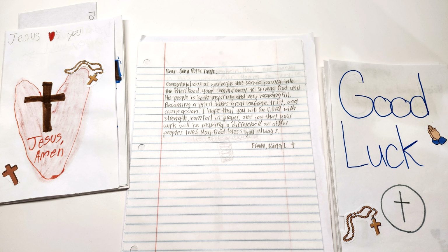 Paterson hits record, sending letters to seminarians through Knights #Catholic – Seminarian John Peter Zappe sometimes feels discouraged by challenging classes and assignments, asking himself, “Why am I doing this?”
Recently, Zappe, a seminarian of the Paterson Diocese, N.J., received several faith-filled letters and cards of encouragement in his studies from local Catholic children. Among these, Nina L., of the religious education program at Immaculate Heart of Mary (IHM) Parish in Wayne, N.J., wrote one of these moving and inspiring letter.
“Congratulations as you begin this sacred journey into the priesthood,” Nina wrote to Zappe, 27. He is finishing his second year of theology studies at Immaculate Conception Seminary in South Orange, N.J. She continued, “Becoming a priest takes great courage, trust, and compassion. I hope that you will be filled with strength, comfort in prayer, and joy that your work will be making a difference in other people’s lives. May God bless you always.”
In March, as part of this ongoing support, Zappe and the diocese’s nine other seminarians received stacks of children’s letters of support, prayers, and appreciation, including from Nina A., courtesy of the Seminarian Letter Project, an annual initiative of the N.J. State Council of the Knights of Columbus.
“These days, it’s nice to get physical letters from students who write that they are praying for you, a man who is studying in seminary and is planning to go into the priesthood. The answer to ‘Why am I doing this?” is them: these young people of God, who are waiting for me to serve them in the future,” said Zappe, who emphasized that he also finds encouragement from other sources, especially from God in prayer. Additionally, he noted, “It’s also great to see that by writing these letters, the children are thinking about their own vocations.”

Click here to subscribe to our weekly newsletter.

This year, the Paterson Diocese set a record by sending more letters and cards to seminarians than ever before. Students in religious-education programs from four parishes provided over 100 pieces of encouragement. Statewide, Catholic school students also participated, according to John Tirado, the council’s faith director who has overseen the Project for 25 years.
In one letter, Linda, also of the Paterson Diocese, sought to motivate the seminarians by writing, “You got this and God’s got you.” Younger children drew cartoon crosses and angels on their cards.
Participating from the Paterson Diocese were: Father Joseph A. Cassidy, Council 6100 in the Budd Lake neighborhood of Mount Olive, N.J.; St. John Vianney Council 12649 in the Stockholm neighborhood of Hardyston, N.J.; John Fitzgerald Kennedy Council 5486 in Lincoln Park, N.J.; and IHM Council 10206 in Wayne. These councils will be recognized at the State Knights’ convention in Wildwood, N.J., in May, Tirado said.
Throughout the state, local Knights’ council Project chairmen coordinate the letter-writing efforts with their Catholic schools and religious education programs. Tirado collects them and forwards them to each diocese. For the Paterson Diocese seminarians, the letters were delivered from the Vocations Office at the annual Chrism Mass on March 31 at the Cathedral of St. John the Baptist in Paterson, N.J.
“The letters are fresh, inspiring, thoughtful, and honest. They are surprising in their depth, and the children’s thinking about the church and vocations. It’s a spiritual gift the seminarians respond to. You don’t get that with Artificial Intelligence,” said Tirado. He noted that their insights get deeper with each successive grade level. “They are also thinking about the men who will be there for them and their families when they get older,” he said.
This year marked the first time the Hardyston and Mount Olive councils participated. The St. John Vianney Council serves St. Thomas the Apostle Parish in the Oak Ridge neighborhood of Jefferson, N.J., and St. John Vianney Parish in Hardyston.
Summing up the project’s impact, Joseph Tarallo, St. John Vianney’s grand knight and Project chairman, said, “The letters brighten the seminarians’ day. If we don’t encourage our seminarians, we won’t have priests. Writing a letter to them is easy to do. The kids enjoy it,” he said.