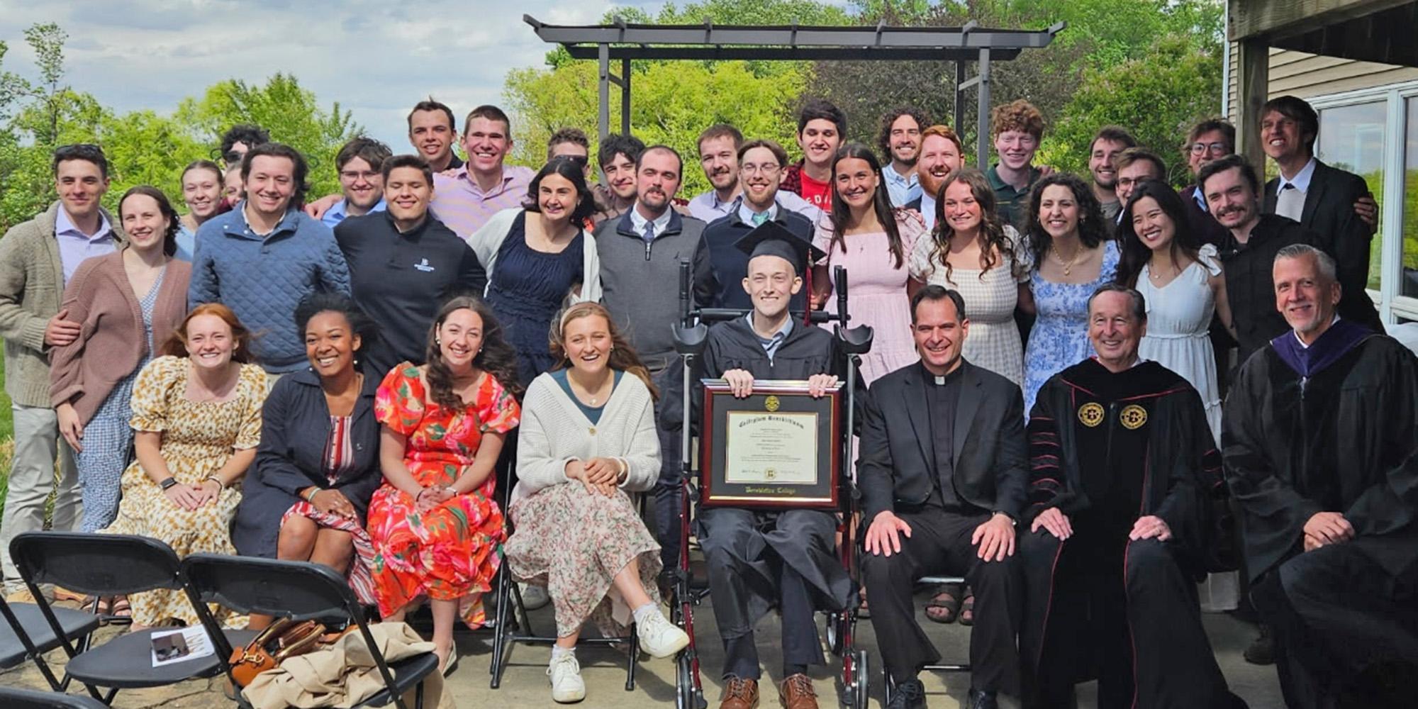 Remembering Alex: Benedictine College grieves a ‘faith-filled’ student - #Catholic - Outside the packed school chapel, Benedictine College students continued to gather, kneeling on the ground to pray for Alex Lynch.On the night of May 8, the news had spread across the campus that Lynch, a Benedictine student suffering from cancer, had died.A college senior, Lynch had just had his graduation ceremony. He didn’t walk the stage, however; instead, the college president went to him.On May 7, Benedictine College President Stephen Minnis traveled from the school in Atchison, Kansas, to Lynch’s family home in Indianola, Iowa, along with 30 Benedictine students for Lynch’s personal baccalaureate Mass and graduation ceremony.“Graduation is a powerful moment for these students,” Minnis told EWTN News. “They have worked so hard for it, including their whole primary and secondary education.”“I want to make that moment special for every student,” he said. “It’s a moment that is powerful for me too — I pray a Hail Mary for every student by name when they come and when they graduate, but I have prayed especially for Alex.”“It just took an extra step in his case, but I didn’t want to miss his big moment,” Minnis said.Father Ryan Richardson, Benedictine Collegeʼs chaplain, told EWTN News he spoke “directly to Alex” in his homily, detailing how Lynch lived out the fruits of the Holy Spirit while at school.“He radiated the Holy Spirit and the love of Christ,” Richardson said. “Alex often said that his desire was that others see Christ in him. He definitely accomplished that.”
 
 Benedictine College chaplain Father Ryan Richardson speaks “directly” to Alex Lynch at his personal baccalaureate Mass on May 7, 2026. | Credit: Photo courtesy of Father Ryan Richardson 
 
 Finnegan Ritchie, a close friend of Lynch’s, was among the 30 students who attended the ceremony.“We were both worried that it was going to be unreasonably long,” Ritchie said in an interview with EWTN News. “Entertaining people is exhausting. But Alex was able to sit and stand at will; he had a lot of grit.”“After the ceremony, he had a little graduation party and greeted his family and friends,” Ritchie said. “It was wonderful to see how everyone came together to bring food, drinks, and tables for the occasion. People were catching up with each other and treating it like any other grad party.”
 
 Alex Lynch and Benedictine College President Stephen Minnis with diploma at Lynch’s at-home commencement ceremony on May 7, 2026. | Credit: Photo courtesy of Finnegan Ritchie
 
 Ritchie said goodbye to Lynch in the evening, “around 5:30 p.m.”“It was very difficult to leave him,” Ritchie said.On May 8, less than a day after his home graduation ceremony, Lynch died. It was late in the evening on a Friday night. Off-campus parties stopped. Students gathered in the chapel, again, this time to pray for a friend who had passed away.“Students left parties and gathered spontaneously in our adoration chapel,” Minnis said. “It was filled until late that night. It was an overwhelming response.”The following day, Benedictine held a Mass on campus in his memory.Students traveled from all over the country for Lynch’s funeral at St. Thomas Aquinas Parish in Indianola, Iowa, on May 14, nearly filling the pews in the church.“He made such an impact,” Minnis said. “The way he lived and the way he died will change these students for years.”Yellow pins and applauseOn Saturday, May 16, just over a week after Lynch died, Benedictine’s official graduation took place. The crowd was peppered with students wearing yellow pins, which they wore, Richardson said, “to remember Alex.”While at Benedictine, Lynch was a resident adviser (RA) on campus. He played intramural sports, was active with FOCUS, and sang in the choir at Mass.“The best way I can describe Alex is that he was faith-filled,” Richardson said. “Faith in Christ was the foundation of his life and his faith in Christ spilled over into all his relationships."“[Lynch] had a friendship with the Holy Spirit that was alive and active,” the chaplain continued.“He loved people sincerely and intensely,” he said. “Even in the midst of his illness he would often look me in the eye and intentionally ask how I was doing and how he could pray for me.”
 
 Alex Lynch and Father Ryan Richardson at Lynch’s graduation celebration on May 7, 2026. | Credit: Photo courtesy of Father Ryan Richardson
 
 “We have grieved as a community,” Richardson said.“Since Alex’s passing, though, I think many of us have transitioned from sadness to peace,” he continued. “In his death Alex showed us what it means to truly live and what it means to live the faith to the end.”Lynchʼs friend Jack Figge, a recent Benedictine graduate and a Catholic journalist, wrote a tribute to Lynch in Benedictineʼs school publication.“I spent three days with Alex at the beginning of the week he passed away. It’s a series of days I will never forget because Alex lived out what it meant to be a suffering servant,” Figge told EWTN News.“He never complained about the pain he was in; he was so generous with his time making sure that everybody who wanted to see him could,” Figge recalled. “Whenever you walked in, the first question he asked was ‘How are you?’”“Even in the midst of being close to death, he remained joyful, laughing, and cracking jokes,” Figge continued. “On the day of his graduation, so many people wanted to say goodbye and he was clearly tired. But he sat and talked with everybody for hours, making sure he had a moment with everybody.”In the last week of his life, Lynch visited his parish to pray a Holy Hour.He died reciting his baptismal promises — promises made by Catholics at baptism and renewed at the Easter Vigil.Benedictine students and faculty remembered Lynch at the schoolʼs graduation ceremony, where Lynch’s parents walked the stage in his place.
 
 Alex Lynchʼs parents and brother accept Lynch’s framed diploma at graduation on May 16, 2026. | Credit: Isabella Wilcox/Benedictine College
 
 “It was truly fitting to have Alex’s family with us at graduation,” Richardson said. “The resounding applause they received was a tribute to the impact that Alex had on each of us and the legacy he has left at Benedictine College.”Shaved heads and a walk down the aisleWhen Lynch discovered he would lose his hair from chemotherapy, 30 of his friends at Benedictine shaved their heads, Ritchie recalled.“We did it to be funny, but we also wanted to present ourselves as Alexʼs friends,” Ritchie said. “He and I, along with many others, had spiritual conversations often — we wanted to do college well. We wanted to know what our purpose in life was and how to go about getting it.”
 
 Benedictine College students shaved their heads in solidarity with Alex Lynch, center, as he went through chemotherapy. Also pictured: Finnegan Ritchie, back row, left, and Jack Figge, third row, third from left. | Credit: Photo courtesy of Finnegan Ritchie
 
 “At the end of the day, we wanted to be virtuous; it was the way to a happier life on earth and an even more perfect one in the next life,” Ritchie said.“Alex sought to see God in everyone he met in order to love them well. We rarely talked about his disease; I figured he wanted to let go of it while he was with people,” he said.“He loved the quiet; he enjoyed eating breakfast at the door to St. Joseph Hall and seeing people he loved walk by,” Ritchie continued. “I was always struck by his take on things, since death was a real threat for him; it put my life in perspective. He taught me that I have a lot to be grateful for, and that it is best to take action now than wait until later.”In one of their last conversations, Lynch told his friend he had learned from him as well. “Iʼm honored to have been taught by him,“ Ritchie said. ”Iʼm even more honored to have taught him something. I think we just wanted to seek God together.”Earlier this year, Lynch walked down the aisle as a groomsman at the wedding of one of his best friends, Ben Shonka, who recently served as a pallbearer at Lynchʼs funeral.“Alex was a goofy man; he loved his faith and loved to have fun,” Shonka, also a Benedictine graduate, told EWTN News. “He made every moment count whether he was with friends or whoever.”
 
 Alex Lynch, right, was among the groomsman at Ben Shonka’s wedding. | Credit: Photo courtesy of Ben Shonka
 
 “He was one of the groomsmen in my wedding because he was one of the best men in my life,” Shonka said. “He really showed me what masculinity could look like at our age.”“He was so intentional in everything he did,” Shonka recalled. “He knew everyone’s name and would always greet them accordingly. He would always be down to talk whenever. He lived a life of prayer, often going to Mass and adoration.”
 
 Alex Lynch, center, with friends, including Ben Shonka, right. | Credit: Photo courtesy of Ben Shonka
 
 After Lynch’s death, Shonka’s wife observed that Lynch had walked down the aisle as a groomsman at their wedding and now her husband had carried Lynch “down the aisle as a pallbearer to his final resting place.”The college president noted the impact Lynch had on both students and himself.“I think the students saw him as a representative of the best of what they are and a model to aspire to,” Minnis said. “I see him that way, too.”