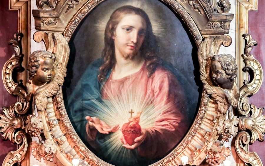 Everything you need to know about devotion to the Sacred Heart of Jesus #Catholic The solemnity of the Sacred Heart of Jesus falls on the Friday after the Corpus Christi octave, which in 2026 is on June 12. What exactly is the meaning behind this feast day? Below are answers to some common questions.Why do Catholics venerate the Sacred Heart of Jesus?“Devoting ourselves to the Sacred Heart is one of the easiest, fastest, and most pleasant ways to grow in holiness,” Father Ambrose Dobrozsi, a priest of the Archdiocese of Cincinnati, told EWTN News.“Many saints have done many things to grow close to Jesus Christ, but no way is more sure and more pleasing to him than to consecrate ourselves to his Sacred Heart through the Immaculate Heart of his mother,” he added.Where does devotion to the Sacred Heart come from?The story behind the modern iteration of the devotion to the Sacred Heart of Jesus, however, begins on Dec. 27, 1673, at a monastery belonging to the Order of the Visitation of Holy Mary (Visitandines) in eastern France.There, a nun named Sister Margaret Mary Alacoque began experiencing visions of the Sacred Heart. Those visions continued for 18 months.During her visions, Sister Margaret Mary learned ways to venerate the Sacred Heart of Christ.These devotions included the concept of a Holy Hour on Thursdays, the creation of the feast of the Sacred Heart after Corpus Christi, and the reception of the Eucharist on the first Friday of every month.As with many mystics, many people were skeptical of Sister Margaret Mary’s claims of visions. Her confessor, the then-Father Claude La Colombière, SJ, (now St. Claude La Colombière) believed her, and eventually, the mother superior of her community began to believe as well.The first feast of the Sacred Heart was celebrated privately at the monastery in 1686.Sister Margaret Mary died in 1690 and was canonized by Pope Benedict XV on May 13, 1920.Initially, the Vatican was hesitant to declare a feast of the Sacred Heart but did allow the Visitandines to celebrate a Mass special to this day. As the devotion to the Sacred Heart of Jesus spread throughout France, the Vatican granted the feast of the Sacred Heart of Jesus to France in 1765.In 1856, after much lobbying by French bishops on behalf of the feast of the Sacred Heart, Pope Pius IX designated the Friday following the feast of Corpus Christi as the feast of the Sacred Heart for the entire Latin-rite Church.On May 25, 1899, Pope Leo XIII promulgated the encyclical Annum Sacrum, which consecrated the entire world to the Sacred Heart of Jesus. This encyclical was written after a nun, Sister Mary of the Sacred Heart, sent two letters to the pope requesting that he consecrate the world to the Sacred Heart of Jesus.Sister Mary of the Divine Heart wrote the letters, she said, after Jesus made the request to her. Pope Leo XIII called this encyclical and the subsequent consecration the “great act” of his papacy.“Finally, there is one motive which we are unwilling to pass over in silence, personal to ourselves it is true, but still good and weighty, which moves us to undertake this celebration. God, the author of every good, not long ago preserved our life by curing us of a dangerous disease,” Leo XIII wrote.“We now wish, by this increase of the honor paid to the Sacred Heart, that the memory of this great mercy should be brought prominently forward, and our gratitude be publicly acknowledged.”But why consecrate the world — or anyone — to the Sacred Heart of Jesus? What does that mean?Pope Leo XIII described the act of consecration as one that will “establish or draw tighter the bonds which naturally connect public affairs with God,” which was especially needed for the world at the turn of the century.“While many see religion as unnecessary in a world with more and more technology and resources, swearing allegiance and consecrating ourselves to Christ the King in his Sacred Heart shows that humanity still needs and longs for a compassionate and all-powerful God,” Dobrozsi, the Cincinnati priest, told EWTN News.“In a society where some live in decadence and prideful luxury while others are destitute, the burning love of Christ’s Sacred Heart reminds us that the fires of his mercy are also fires of justice. And when the culture, and so many of us, feel hopeless that we could ever change after falling to sins of the flesh, the heart of Our Lord beats with powerful love, eternally declaring that true charity has triumphed over sin and death,” he added.These are the promises the Sacred Heart of Jesus made to St. Margaret Mary Alacoque:1. I will give them all the graces necessary for their state of life.2. I will give peace in their families.3. I will console them in all their troubles.4. I will be their refuge in life and especially in death.5. I will abundantly bless all their undertakings.6. Sinners shall find in my heart the source and infinite ocean of mercy.7. Tepid souls shall become fervent.8. Fervent souls shall rise speedily to great perfection.9. I will bless those places wherein the image of my Sacred Heart shall be exposed and venerated.10. I will give to priests the power to touch the most hardened hearts.11. Persons who propagate this devotion shall have their names eternally written in my heart.12. In the excess of the mercy of my heart, I promise you that my all powerful love will grant to all those who will receive Communion on the first Fridays, for nine consecutive months, the grace of final repentance: They will not die in my displeasure, nor without receiving the sacraments; and my heart will be their secure refuge in that last hour.This story was first published on EWTN News on June 19, 2020, and has been updated. Everything you need to know about devotion to the Sacred Heart of Jesus #Catholic The solemnity of the Sacred Heart of Jesus falls on the Friday after the Corpus Christi octave, which in 2026 is on June 12. What exactly is the meaning behind this feast day? Below are answers to some common questions.Why do Catholics venerate the Sacred Heart of Jesus?“Devoting ourselves to the Sacred Heart is one of the easiest, fastest, and most pleasant ways to grow in holiness,” Father Ambrose Dobrozsi, a priest of the Archdiocese of Cincinnati, told EWTN News.“Many saints have done many things to grow close to Jesus Christ, but no way is more sure and more pleasing to him than to consecrate ourselves to his Sacred Heart through the Immaculate Heart of his mother,” he added.Where does devotion to the Sacred Heart come from?The story behind the modern iteration of the devotion to the Sacred Heart of Jesus, however, begins on Dec. 27, 1673, at a monastery belonging to the Order of the Visitation of Holy Mary (Visitandines) in eastern France.There, a nun named Sister Margaret Mary Alacoque began experiencing visions of the Sacred Heart. Those visions continued for 18 months.During her visions, Sister Margaret Mary learned ways to venerate the Sacred Heart of Christ.These devotions included the concept of a Holy Hour on Thursdays, the creation of the feast of the Sacred Heart after Corpus Christi, and the reception of the Eucharist on the first Friday of every month.As with many mystics, many people were skeptical of Sister Margaret Mary’s claims of visions. Her confessor, the then-Father Claude La Colombière, SJ, (now St. Claude La Colombière) believed her, and eventually, the mother superior of her community began to believe as well.The first feast of the Sacred Heart was celebrated privately at the monastery in 1686.Sister Margaret Mary died in 1690 and was canonized by Pope Benedict XV on May 13, 1920.Initially, the Vatican was hesitant to declare a feast of the Sacred Heart but did allow the Visitandines to celebrate a Mass special to this day. As the devotion to the Sacred Heart of Jesus spread throughout France, the Vatican granted the feast of the Sacred Heart of Jesus to France in 1765.In 1856, after much lobbying by French bishops on behalf of the feast of the Sacred Heart, Pope Pius IX designated the Friday following the feast of Corpus Christi as the feast of the Sacred Heart for the entire Latin-rite Church.On May 25, 1899, Pope Leo XIII promulgated the encyclical Annum Sacrum, which consecrated the entire world to the Sacred Heart of Jesus. This encyclical was written after a nun, Sister Mary of the Sacred Heart, sent two letters to the pope requesting that he consecrate the world to the Sacred Heart of Jesus.Sister Mary of the Divine Heart wrote the letters, she said, after Jesus made the request to her. Pope Leo XIII called this encyclical and the subsequent consecration the “great act” of his papacy.“Finally, there is one motive which we are unwilling to pass over in silence, personal to ourselves it is true, but still good and weighty, which moves us to undertake this celebration. God, the author of every good, not long ago preserved our life by curing us of a dangerous disease,” Leo XIII wrote.“We now wish, by this increase of the honor paid to the Sacred Heart, that the memory of this great mercy should be brought prominently forward, and our gratitude be publicly acknowledged.”But why consecrate the world — or anyone — to the Sacred Heart of Jesus? What does that mean?Pope Leo XIII described the act of consecration as one that will “establish or draw tighter the bonds which naturally connect public affairs with God,” which was especially needed for the world at the turn of the century.“While many see religion as unnecessary in a world with more and more technology and resources, swearing allegiance and consecrating ourselves to Christ the King in his Sacred Heart shows that humanity still needs and longs for a compassionate and all-powerful God,” Dobrozsi, the Cincinnati priest, told EWTN News.“In a society where some live in decadence and prideful luxury while others are destitute, the burning love of Christ’s Sacred Heart reminds us that the fires of his mercy are also fires of justice. And when the culture, and so many of us, feel hopeless that we could ever change after falling to sins of the flesh, the heart of Our Lord beats with powerful love, eternally declaring that true charity has triumphed over sin and death,” he added.These are the promises the Sacred Heart of Jesus made to St. Margaret Mary Alacoque:1. I will give them all the graces necessary for their state of life.2. I will give peace in their families.3. I will console them in all their troubles.4. I will be their refuge in life and especially in death.5. I will abundantly bless all their undertakings.6. Sinners shall find in my heart the source and infinite ocean of mercy.7. Tepid souls shall become fervent.8. Fervent souls shall rise speedily to great perfection.9. I will bless those places wherein the image of my Sacred Heart shall be exposed and venerated.10. I will give to priests the power to touch the most hardened hearts.11. Persons who propagate this devotion shall have their names eternally written in my heart.12. In the excess of the mercy of my heart, I promise you that my all powerful love will grant to all those who will receive Communion on the first Fridays, for nine consecutive months, the grace of final repentance: They will not die in my displeasure, nor without receiving the sacraments; and my heart will be their secure refuge in that last hour.This story was first published on EWTN News on June 19, 2020, and has been updated.