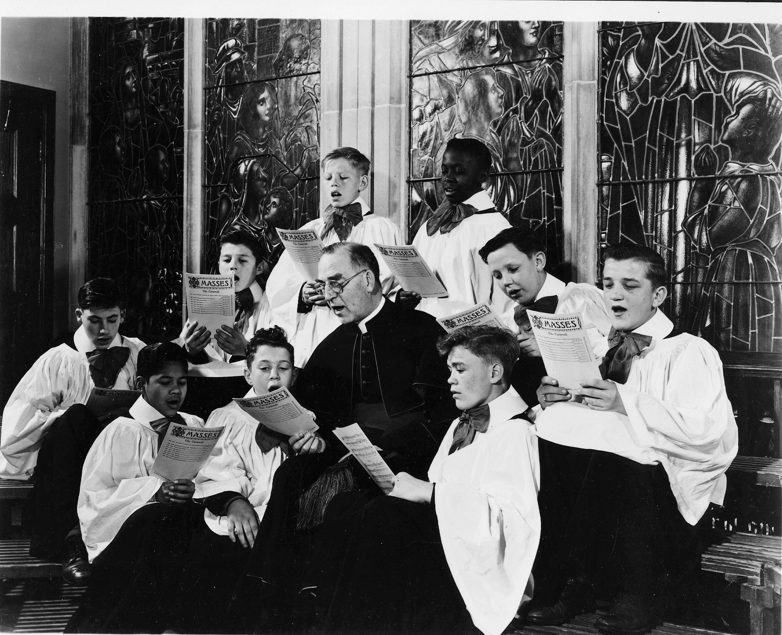Father Flanagan's mission continues at Boys Town more than a century after its founding - #Catholic - More than 100 years after its founding, Boys Town continues to advance Venerable Father Edward J. Flanagan’s mission of caring for the vulnerable and underserved, reaching more than 2 million children and families every year.The Irish-born priest is revered for his revolutionary approach to caring for homeless children in the 20th century, leading him to be declared “Venerable” by Pope Leo XIV in March, 2026.Following the advancement of Flanagan’s canonization cause, Thomas Lynch, who serves as the historian and director of community programs for Boys Town, told EWTN News that the priest’s life serves as an example of “how children can be treated and how to treat your fellow man too.”“Venerable Father Flanagan was born and raised in Ireland in a very devout Catholic family, and he had a great devotion to helping people from the examples of his mother and father,” Lynch said.
 
 Flanagan family portrait taken in 1908. Photo courtesy of Boys Town.
 
 He was born in County Galway in 1886, and moved to America in 1904. His journey through seminary was put on hold due to poor health, but he was eventually ordained in 1912.
 
 Father Edward J. Flanagan arriving to Ellis Island in 1904. Photo courtesy of Boys Town.
 
 While the priest is known for rescuing homeless children and housing them at Father Flanaganʼs Boys Home, his work went beyond aiding children at the village now known as Boys Town.Flanagan had “special ideas and concepts in child care…that were so radical,” but it came “from his concepts of being a Catholic priest of love and dignity for the individual,” Lynch said. “It changed the way children were treated around the world.”Flanagan was “a great champion for civil rights,” Lynch said. “He traveled across America advocating equality regardless of a personʼs race or religion. He felt that [was] one of the greatest stains in America — any type of religious or racial discrimination.”“Many people donʼt realize he went out of his way to help Japanese Americans during World War II. During the internment, he helped around 200 to 300 of them leave the camps and begin new lives, and he brought a number of them to live in the village of Boys Town.”Creating Boys Town ‘with love’ “When Father Flanagan created Boys Town in 1917, unfortunately, in America, there were no child care programs existing that were standard across the country,” Lynch said. “There were reform schools,” but they were “terrible places.”In the schools, “children would commit suicide because the guards would be so violent,” he said. Many of the children were also in orphanages, but “when you became a teenager, you were expelled.”To combat the issue, Flanagan “came forward and said: ‘Theyʼre going to live with me. Theyʼre going to have love, education, a spiritual life, and be taught a trade. Itʼll be done. No corporal punishment. No verbal abuse. Theyʼll live as a family.’”To start Boys Town, Flanagan used “the borrowed $90 he had,” Lynch said. “He had no money and no one really believed in him except for a few people in the city of Omaha.”“But he always said: 'God would provide.’”
 
 Father Edward J. Flanagan and boys at the German-American Home in South Omaha, which served as Flanaganʼs Home for Boys from 1918 to 1921. Photo courtesy of Boys Town.
 
 At Boys Town, “he created one of the first intentionally integrated communities in America…and he did it all with love,” he said. “He referenced love almost every day, in every sermon, and in every prayer.”Flanagan’s success caught the attention of people across the globe, leading his life and legacy to be immortalized in the 1938 movie “Boys Town,” starring Spencer Tracy, who won an Oscar for his portrayal of the priest.
 
 Father Edward J. Flanagan with Mickey Rooney and Spencer Tracy who were actors in the 1938 movie “Boys Town.” Photo courtesy of Boys Town. 
 
 Flanagan’s work was also esteemed by multiple presidents and leaders. “President Franklin Roosevelt said America needed 49 more Father Flanaganʼs, one for every state and territory, because his ideas were so far forward and proving successful,” Lynch said.In 1947, Flanagan was even invited by Gen. Douglas MacArthur, who was leading the allied occupation of Japan, to review the child welfare conditions in Japan and Korea. 
 
 Father Edward J. Flanagan speaking to children with the priest of Nagasaki Oura Church in Japan. Photo courtesy of Boys Town.
 
 After the trip, Flanagan culminated a report, “Children of Defeat,” which included findings on the devastating conditions of children left homeless and abandoned by World War II across Asia. He presented it to President Harry Truman at the White House on July 11, 1947.