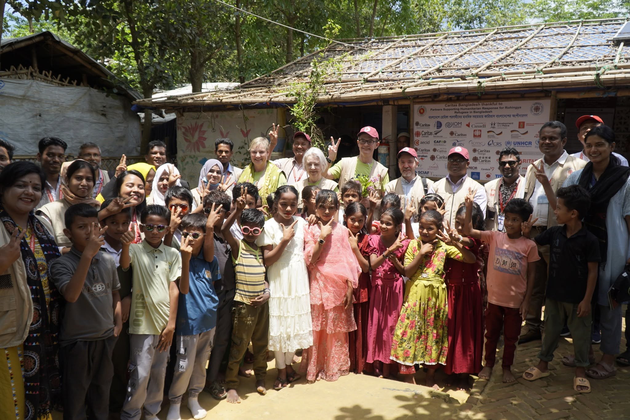 Funding cuts force Catholic charity to scale back Rohingya aid in Bangladesh #Catholic Caritas Bangladesh has been forced to scale back its relief work for Rohingya refugees in the city of Coxʼs Bazar as funding from foreign donors declines, its emergency response director said.“Our biggest challenge now is funding,” said Liton Luis Gomes, project director of Caritas Bangladeshʼs Emergency Response Program.“We only received 60% of the funds we planned for this fiscal year; we didnʼt get the remaining 40%,” Gomes told EWTN News by phone. “Thatʼs why we had to reduce the quantity while maintaining the quality of our services.”The cuts have fallen hardest on shelter and hygiene work. “If we used to be able to repair 500 houses, now it has decreased by 50%. If someone asks for a hygiene kit like soap, we canʼt give it urgently,” Gomes said.A shrinking budgetThe decline in donor support has been steep. Caritas Bangladesh reported receiving about 916 million taka ($7.4 million) for its Rohingya response in 2017–18. Support fell to about 468 million taka ($3.8 million) in 2020 and about 417 million taka ($3.4 million) in 2024. It rose to about 531 million taka ($4.3 million) in 2025 before falling again to about 427 million taka ($3.5 million) so far in 2026, the agency said.Even so, Gomes said, the charity is maintaining the services that do not require money. “We are doing things like training volunteers for the crisis period, raising awareness about disaster relief,” he said.Caritas Bangladesh has worked in the camps since the 2017 exodus, providing shelter, water and sanitation, child protection, and education. Between 2017 and 2024, its shelter and settlement program reached an average of 38,335 households a year, the charity said, through transitional shelter assistance, repairs, tarpaulin distribution, and monsoon support. It runs 12 learning centers and two youth and adolescent centers in the camps, teaching children under the Myanmar curriculum.Lives in the campsThe charityʼs work is felt in individual lives. Mohammad Arshad, 23, who lives in Camp 19, has volunteered in the shelter program of Caritas Bangladeshʼs Emergency Response Program since 2018. He had studied up to class nine in Myanmar and helped his father run a grocery shop before the family was forced to flee. With no stable income and eight people to support, including his aging parents, his wife, his young son, and two younger siblings, he had lain awake wondering how he would provide.“The job was more than just a source of income; it gave me a sense of purpose. I learned how to organize workers, coordinate with engineers, and develop technical skills,” Arshad told EWTN News.“This opportunity had not only helped me; it supports my family but also [has] given me hope for a better future. As I watched my son sleep peacefully at night, [I] whispered silent thanks, to Caritas Bangladesh, to the people who had trusted me, to the strength that kept me going,” Arshad added.Momtaz Begum, a vulnerable woman who received income-generating support through Caritas, described a similar turnaround. “My husbandʼs addiction left us in debt, and after he abandoned us, I struggled to provide for my family by raising poultry and growing vegetables. The COVID-19 pandemic made things worse, leaving us without food or income. When our home was destroyed in the rain, I moved to my fatherʼs house, where I faced mistreatment from relatives,” she told EWTN News.On Jan. 18, 2022, Begum received 25,000 taka (about $200) from Caritas Bangladesh to start an income-generating activity. She used the money to expand her cloth business. “Earlier, I had to share profits with a shopkeeper, but now I buy cloth independently and keep all the profit. This has increased my daily earnings to 400-500 taka [about $3 to $4], allowing me to save … money,” Begum told EWTN News.A stateless peopleRohingya refugees have fled Myanmar for Bangladesh since the 1970s. In the 1990s, more than 250,000 sheltered in Coxʼs Bazar, though all but 20,000 were repatriated after a campaign that began in the early 2000s. The influx resumed in 2015, and by 2017 an estimated 300,000 Rohingya were in Bangladesh. About 537,000 more fled across the border to Coxʼs Bazar in August 2017 as violence intensified in Myanmarʼs Rakhine state, prompting the United Nations to call the situation “a textbook example of ethnic cleansing.” By December 2023, 971,904 Rohingya were living in 33 camps in the Coxʼs Bazar district. Pope Francis met a group of Rohingya refugees during his apostolic visit to Bangladesh in 2017.Looking ahead, Caritas Bangladesh said it aims to build stronger links between the refugees it assists and local businesses, and to deepen cooperation with government and aid agencies, even within a tighter budget.