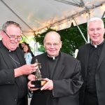 Making history: St. Paul Inside the Walls honors archivist #Catholic - On June 6, Msgr. Raymond J. Kupke, Ph.D., a retired priest with 53 years actively serving the Paterson Diocese, N.J., and respected Church historian, delighted in receiving the 2026 Bishop Arthur J. Serratelli Evangelization Award from St. Paul Inside the Walls Catholic Center for Evangelization in Madison, N.J. Msgr. Kupke received the award for his fruitful years in the priesthood and evangelization.
That Friday evening, Bishop Kevin J. Sweeney presented Msgr. Kupke received the award during St. Paul’s Fifth Annual Garden Party, its largest annual fundraiser, which was held on the center’s front lawn. Msgr. Kupke has been the diocesan archivist since 1976 and is the co-host of “Coffee with Kupke,” a popular podcast that delves into the history of Catholicism in the Church of Paterson. He hosts the podcast with his friend, Father Paul Manning, diocesan vicar for evangelization and education.
Msgr. Kupke is an adjunct professor of Church history at Immaculate Conception Seminary School of Theology in South Orange, N.J. He has also taught many courses at St. Paul’s, notably helping form candidates for the permanent diaconate. He also authored the book, “Living Stones: A History of the Catholic Church in the Diocese of Paterson.”

Click here to subscribe to our weekly newsletter.

Over the years, Msgr. Kupke has held numerous pastoral assignments. Most recently, he served as pastor of St. Anthony Parish in Hawthorne, N.J., from 2011 until his retirement last year.
During the Garden Party, Father Manning also welcomed Father Pawel Tomczyk back to St. Paul’s. For years, Father Tomczyk has assisted St. Paul’s evangelization efforts.
Father Tomczyk, who has served as pastoral formation director and assistant moral theology professor at Immaculate Conception Seminary School of Theology, will assume Father Manning’s role as diocesan vicar for evangelization while living at St. Paul’s, effective July 1.
On that date, Father Manning will become pastor of St. Joseph Parish in Mendham, N.J., while continuing as vicar for education. Father Manning will celebrate his final Mass at St. Paul’s, the young adult Mass, on Sunday, June 21, at 11 a.m., followed by a reception.
Founded by Bishop Serratelli, St. Paul’s is a leader, catalyst, and model for the new evangelization. Through both traditional and innovative programs, the center has inspired people of all ages, beliefs, cultures, perspectives, and professions to fully experience the Catholic faith. The Garden Party celebrated St. Paul’s lasting impact and growth around the diocese and beyond.
The event’s attendees included staff from St. Paul’s, members of the Young Adult Ministry, benefactors, and friends and family of community members. The event included a dinner.
BEACON PHOTOS | JOE GIGLI
 [See image gallery at beaconnj.org] &nbsp;