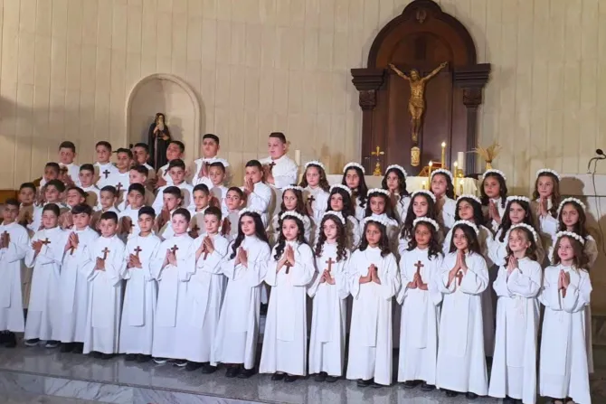 More than 50 children celebrate first Communion amid ongoing missile attacks in southern Lebanon #Catholic Amid a rocket attack launched by Hezbollah on residential homes in the village of Rmeish in southern Lebanon, more than 50 children celebrated their first Communion in a testament to faith, resilience, and hope in the midst of war.In comments to local media, Rmeish Municipality Head Hanna Al-Amil said a missile fell between inhabited homes on Sunday morning and “narrowly avoided causing a major disaster.”Al-Amil stressed that the village contains no military forces, armed groups, or weapons, emphasizing that residents “simply want to live safely on their land, away from confrontation and escalation.”The people of Rmeish remain attached to their land and continue their lives “despite difficult circumstances,” he said, calling for the protection of civilians and for the village and its residents not to be placed at risk. The incident is not an isolated one. It comes amid a series of missile launches affecting Christian villages in the south, increasing fears among local residents. On Friday, several Hezbollah rockets fired toward Israeli forces operating in the town of Dibbin landed in residential and civilian areas of Marjayoun, causing significant property damage. According to local reports, one rocket struck the Greek Orthodox Church of St. George, damaging parts of the church, while another landed within the grounds of the Sacred Hearts Secondary School, leaving extensive destruction to the building and its surroundings.Speaking to ACI MENA, the Arabic-language sister service of EWTN News, Rizkallah Alam, a resident of Rmeish whose daughter received her first Communion, said villagers have effectively been living in a state of war since Oct. 8, 2023. “We have been living the reality of war since then,” he said, adding that the village has not experienced a genuine ceasefire at any point. “The children and their parents live in constant anxiety. We asked to postpone the first Communion to another time, but our parish priest refused and insisted that it take place.”Alam described the daily reality facing children in the village, saying they live without a sense of security or psychological stability. “My children pray and sing hymns all the time, and they live according to the news cycle. Some days schools are open, and other days they are not. Today the situation has become even worse because of the siege.”He said the restrictions affecting the village have impacted even the most basic aspects of daily life. “Everything has become unavailable. We wait for the aid convoy and hope it will be allowed to reach the village.”In previous years, families would hold large celebrations for first Communion. This year, however, circumstances forced them to scale back their plans. “This year the celebration was limited to family homes, with no large festivities,” he said. “The number of children was also lower than in previous years because families are scattered. Some are in Beirut, while others have left the country.”Alam described the immense uncertainty facing both parents and children. “The situation is extremely difficult. We cannot even plan for tomorrow,” he said. “As we speak, rockets have fallen in Rmeish again, one person has been injured, and a car has caught fire.”Between missiles and first Communion, Rmeish embodies one of southern Lebanonʼs most painful paradoxes: a village that wants to live, families determined to remain, and children learning faith in a time of fear. This story was first published by ACI MENA, the Arabic-language sister service of EWTN News, and has been translated for and adapted by EWTN News English.