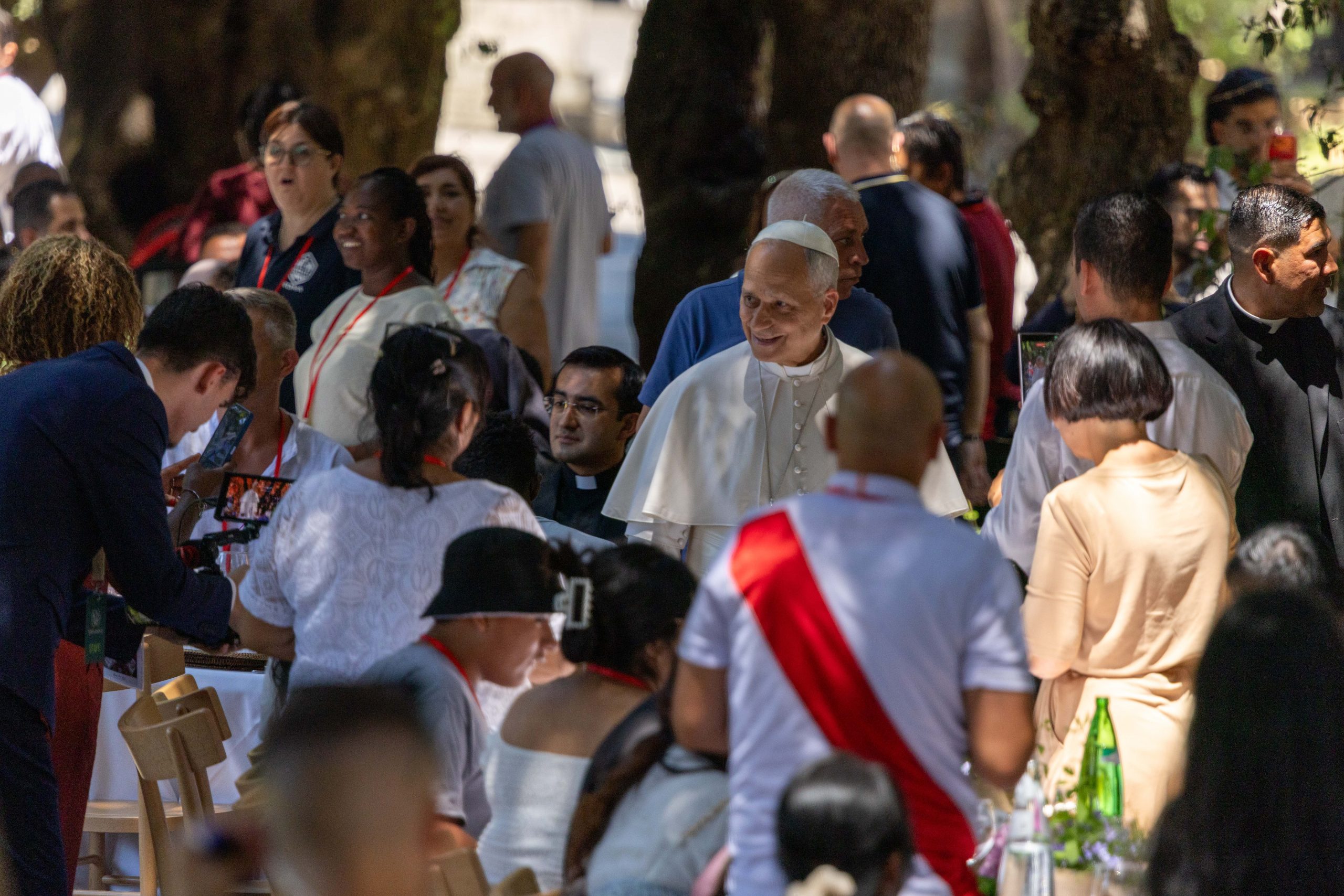 At lunch with the poor, Pope Leo XIV calls on society to eliminate the causes of poverty, injustice - #Catholic - Pope Leo XIV on July 11 expressed a “hunger for justice [and] authentic charity” while attending a lunch with poor people at Castel Gandolfo outside of Rome. “[I have] a hunger for a Church that truly knows how to open its doors and receive everyone — where there is love for all and no one is an enemy, where we all know how to live out reconciliation, forgiveness, and peace,” the pope told the crowd at the lunch, hosted in the gardens of the Borgo Laudato Si’. 
 
 Pope Leo XIV dines with guests during a lunch for poor people at Castel Gandolfo outside of Rome, July 11, 2026. The event was the second lunch the pope has hosted with those facing poverty since the beginning of his pontificate. | Credit: Daniel Ibáñez/EWTN News
 
 Leo pointed out that the historic papal title of “pontiff” means “a builder of bridges.” “Today, we too wish to build a bridge with all of you, with your families, and with the society in which we want to live — but to live with justice, to live where the causes of poverty can be eliminated, where the causes of the injustices that still exist in our world can be removed,” he said. 
 
 Pope Leo XIV and guests sit for lunch at Castel Gandolfo outside of Rome, July 11, 2026. The event was the second lunch the pope has hosted with those facing poverty since the beginning of his pontificate. | Credit: Daniel Ibáñez/EWTN News
 
 “This is the Church we want to be,” he said while thanking the organizers of the lunch, the second such event the pope has hosted since his pontificate began. “When we gather together, when we experience this spirit of encounter around the table — the very table where Jesus is present with us — we are truly building a different world, a world of hope. Let us strive always to embody this experience of a Church of justice, peace, and love,” he said.Before the pope spoke, Cardinal Fabio Baggio — the incoming pro-prefect of the Dicastery for Promoting Integral Human Development — had addressed the gathering. 
 
 Cardinal Fabio Baggio speaks during a lunch for poor people at Castel Gandolfo outside of Rome, July 11, 2026. The event was the second lunch Pope Leo XIV has hosted with those facing poverty since the beginning of his pontificate. | Credit: Daniel Ibáñez/EWTN News
 
 “At a time when the ‘throwaway culture’ risks relegating many people to the margins, this place seeks to be a small sign of hope,” the cardinal said. “Here, we wish to remind everyone — through our lives rather than just our words — that no one is superfluous in the eyes of God and that every person is a gift to the entire community.”About 200 people facing social vulnerability from the Diocese of Rome attended the lunch with the pope. On Aug. 17, 2025 the pope hosted a similar lunch with people living in poverty from the Diocese of Albano; he held another such luncheon on Nov. 16 of that year.This story was first published by ACI Stampa, the Italian-language sister service of EWTN News. It has been translated and adapted by EWTN News English.&nbsp;