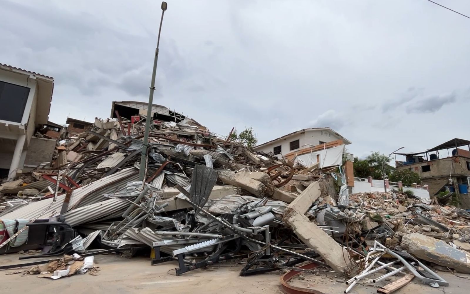 Earthquake survivor in Venezuela: ‘The Miraculous Medal saved me’ #Catholic In Playa Grande, a neighborhood in the city of La Guaira, Venezuela, Kamar Galíndez was on the top floor of Chipi’s Beach Hotel, preparing to start his daily workout in the gym, unaware that his life was about to change forever.It was Wednesday, June 24, the feast day of St. John the Baptist and a national holiday commemorating the anniversary of the decisive Battle of Carabobo. At 6:05 p.m., the peaceful atmosphere created by the stunning ocean view from the top of the hotel was shattered by the thunderous violence of two consecutive earthquakes that took everyone by surprise, sowing anguish and confusion.Speaking with ACI Prensa, the Spanish-language sister service of EWTN News, Galíndez, a 53-year-old lawyer, recalled how the heavy gym machines began moving from one side to the other, much like an air hockey puck. Disaster struck within seconds.“The floor split, and immediately I saw half the building tilting forward while the section I was in collapsed straight down; I felt my feet were no longer standing on anything, and the next thing [I knew], I was trapped in the rubble,” he recounted.
 
 Remains of Chipi’s Beach Hotel in Playa Grande, from which Kamar Galíndez managed to come out alive. | Credit: Andrés Henríquez/EWTN News
 
 Faced with imminent death: ‘Lord, have mercy!’Galíndez recounted that the only thing he managed to do was to seek protection beside a nearby wall. As he felt the building collapsing, what came to his mind was the image of the Lord Jesus as he first appeared to St. Faustina Kowalska on Feb. 22, 1931.“I remember thinking of the merciful Christ and praying, ‘Lord, have mercy,’” he said, on the verge of tears. “The next thing was feeling the building collapse because with that violent shaking, I kept saying, ‘It’s going to fall,’ and of course, it did.”Galíndez never lost consciousness. He said he felt every blow but that “amid the shock and fear, physical sensations become secondary.” Once the confusion of the collapse subsided, he realized he was alive, though his body was completely buried in the rubble and pinned by a massive beam crushing his chest.He couldn’t breathe properly. His head had not been buried, and through that immense mountain of twisted metal, bricks, and earth, he could see the sky, still lit by the last rays of the evening sun. All around, the desperate screams of other people trapped in the rubble could be heard.Galíndez wiped his face and tried to move to free himself. Then he realized his left arm was broken: “A lot of desperation, a lot of fear” is what he recalled feeling, yet amid the suffering, he didn’t hesitate to entrust himself to God’s protection.“Then I prayed to stay calm. What I did was to pray a lot: ‘OK, Father God, help me get out of here. Keep me calm’ was the first thing I prayed. ‘Keep me calm and tell me what I need to do,’” he recounted.He signaled for help as best he could. He said he has no idea how long he was underneath the rubble, but he knows it “felt like an eternity.” Finally, a man who had climbed the mountain of debris helped him break free.‘The Miraculous Medal saved me’Galíndez made his way down the remains of the collapsed building on his own. Upon realizing the magnitude of the tragedy, which claimed thousands of lives in a split second, he is positive that emerging virtually unharmed was a miracle, one he attributes to Our Lady of the Miraculous Medal, to whom he has always been devoted.“I was wearing a small chain with a crucifix and a tiny medal of the Miraculous Virgin. Among the things I lost track of, the chain broke, though, of course, I hadnʼt noticed it at the time,” he recalled.On his way to his home, which was also completely destroyed, a couple of young people helped Galíndez with first aid. While they were tending to him, he became aware of one of those small miracles that holds profound meaning for someone with sincere faith.He asked the young people to help him put his watch into one of the pockets of his shorts, as he needed to remove it to hold his fractured arm still. And then, the inexplicable happened.“I was wearing shorts with a small zippered pocket, and when I looked — don’t ask me where from, don’t ask me how — a piece of the chain and the Miraculous Medal were caught inside.”"Of course, I told the boy: ‘Please, put that little medal away for me too, because that was what saved me,’” he said. “I havenʼt the slightest doubt.”“Absolutely, absolutely,” he replied when asked if he truly believes his life is a miracle obtained through the intercession of the Blessed Virgin.
 
 The Miraculous Medal that Kamar Galíndez wore around his neck, which broke during the collapse and later appeared — inexplicably — in the pocket of his shorts. | Credit: Andrés Henríquez/EWTN News
 
 Many people didn’t make it out of what was left of the hotel. For Galíndez, having survived is the work of the mercy of God, who listened to his pleas in every instant and granted him his request for a reason he still does not know.“In the greatest adversity, you begin to see it in terms of what is most basic, because the most basic thing becomes impossible. When the most basic thing is impossible and you manage to do it anyway, you say: ‘Only God can do that,’” he reflected.“There is a God who looks after you in that moment, attending to what you are asking of him and what you need. From freeing up an arm or reminding you of his presence by leaving a small medal hanging from your [shorts],” he said. He then emphasized what he considers most important following his harrowing experience: "I have the greatest gift God [my dear] Father gave me, which is life.”Galíndez said he feels deeply grateful to be alive. For him, what happened serves as a humbling reminder that what we have comes from the will and mercy of God, who does not abandon his people; who does not abandon Venezuelans, especially during times of greatest suffering.At the time of publication, the official death toll in Venezuela from the double earthquake has risen to 3,535, while the number of injured has reached 16,740. Estimates by independent organizations indicate that tens of thousands of people are still missing.This story was first published by ACI Prensa, the Spanish-language sister service of EWTN News. It has been translated and adapted by EWTN News English.