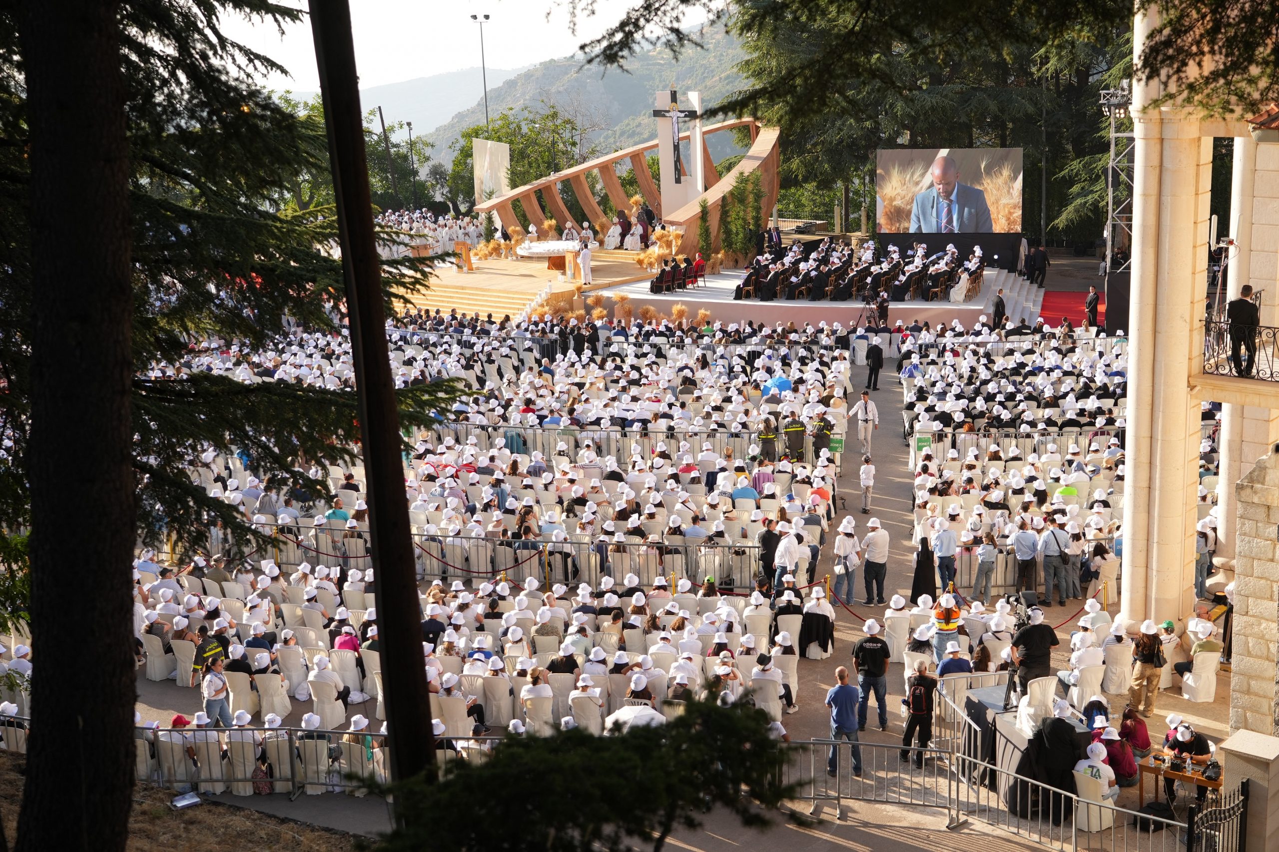 Lebanon celebrates historic beatification of Maronite Patriarch Elias Hoyek – #Catholic – The Maronite Catholic Church gathered on the evening of July 25 at the Maronite patriarchate’s summer residence in Dimane, northern Lebanon, to celebrate the beatification of Patriarch Elias Hoyek, marking an extraordinary moment for both the Church and the Lebanese nation.Cardinal Bechara Boutros Rai, the Maronite patriarch, presided over the official liturgical celebration. Cardinal Marcello Semeraro, prefect of the Vatican’s Dicastery for the Causes of Saints, attended as the representative of Pope Leo XIV alongside patriarchs, bishops, and Lebanese officials, including President Joseph Aoun and Prime Minister Nawaf Salam.
 
 Clergy process through the crowds for the solemn Mass presided over by Cardinal Bechara Boutros Rai on July 25, 2026, for the beatification of Patriarch Elias Hoyek. | Credit: Photo courtesy of Maronite Patriarchate/ACI MENA
 
 The ceremony began with a formal petition presented to the pope’s representative by Bishop Mounir Khairallah, Maronite bishop of Batroun and petitioner for the beatification cause, requesting that Hoyek be declared blessed.Bishop Hanna Alwan, patriarchal vicar general and postulator of the cause before the Holy See, then read the official biography of the new blessed, recounting the principal stages of his life.Semeraro subsequently read the apostolic letter issued by Pope Leo XIV formally enrolling Patriarch Elias Peter Hoyek among the blessed. The decree granted the petition of the Maronite Church, its bishops, and its faithful and designated June 5 as the date of his annual liturgical memorial.The pope’s representative also presented the Maronite Church with five original copies of the decree as official documentation of the occasion.A large official icon of the new blessed was then unveiled. His relics were brought forward in a solemn procession accompanied by 32 lit candles, symbolizing the 32 years Hoyek served as Maronite patriarch, from 1899 to 1931.
 
 A view of the solemn Mass presided over by Cardinal Bechara Boutros Rai on July 25, 2026, for the beatification of Patriarch Elias Hoyek. | Credit: Photo courtesy of Maronite Patriarchate/ACI MENA
 
 In his homily, Rai said: “Hoyek entrusted himself completely to divine providence until he became a radiant sign in the history of the Church and of Lebanon.”“The Church today is not raising a man to earthly glory,” he continued, “but bearing witness to the glory God brought about in him. Holiness is not an honor bestowed by the earth but a divine gift granted to those who live the Gospel faithfully to the end.”Addressing Semeraro, Rai said the cardinal’s presence embodied the depth of communion between the Maronite Church and the Church of Rome. He added that it carried a message of love and appreciation from Pope Leo XIV to a Church that has remained faithful to the faith and to its witness to Christ in the Middle East.Rai emphasized that “the new blessed lived by his famous motto, ‘My God, may your will be done.’ He was a man of divine providence, combining in his person the vigilance of a shepherd, the wisdom of a leader, the heart of a father, and the faith of a saint.”“He never sought personal glory,” Rai added, “but rather the glory of God and the good of the human person, believing that Lebanon is a message and that the human person is its greatest treasure.”
 
 A view of the solemn Mass presided over by Cardinal Bechara Boutros Rai on July 25, 2026, for the beatification of Patriarch Elias Hoyek. | Credit: Photo courtesy of Maronite Patriarchate/ACI MENA
 
 At the conclusion of the Mass, Aoun was presented with a cedar tree carved from Lebanese stone bearing the likeness of the new blessed and containing one of his relics. Following the final blessing, Hoyek’s relics were carried in procession through the aisles among the faithful.This story was first published by ACI MENA, the Arabic-language sister service of EWTN News. It has been translated and adapted by EWTN News English.