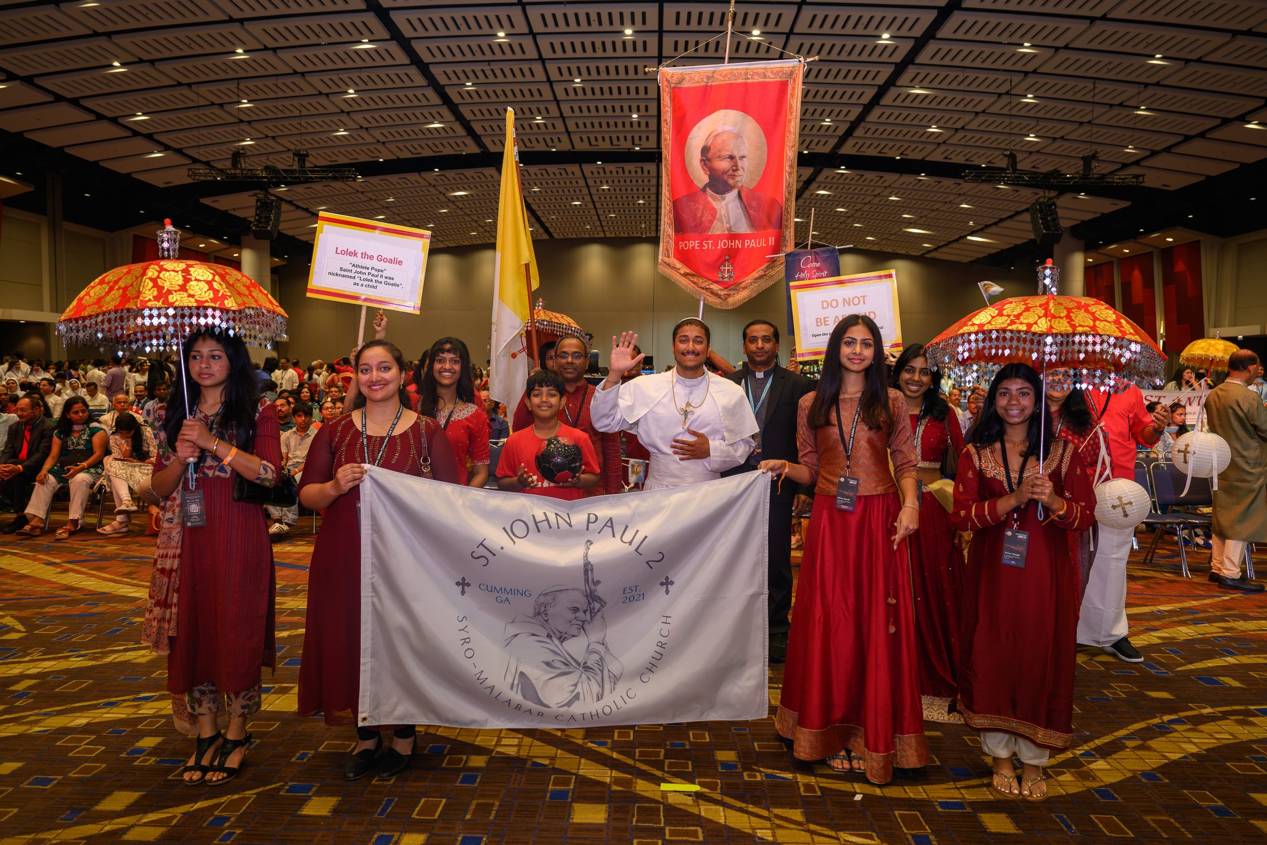 Syro-Malabar Church in the U.S. gathers for joyful celebration of unity – #Catholic – CHICAGO — While most Christians can’t trace their faith lineage to a specific saint, Syro-Malabar Catholics know exactly who brought their ancestors the faith. They proudly call themselves “St. Thomas Christians” — descendants of the first Christians to whom St. Thomas the Apostle brought the Gospel in Kerala, India, in A.D. 52.The Syro-Malabar community came together July 9–12 in Chicago for “Syro26,” a jubilee convention not only to honor its 25th year as an official eparchy in the U.S. but also to reaffirm and celebrate its unity as a church after liturgical disputes in India nearly led to a schism last year.Counting some 5 million members worldwide, the Syro-Malabar Catholic Church is the largest of the 22 Eastern Catholic churches in communion with Rome. Originally found mostly in India, the church has experienced explosive growth in the U.S. during the 21st century.Just 25 years ago, St. John Paul II established the St. Thomas Syro-Malabar Catholic Eparchy to serve the growing immigrant community. Headquartered in Chicago, the eparchy — what Western Churches call a “diocese” — has jurisdiction over the entire U.S., a region that includes some 87,000 souls who attend 53 parishes and 32 missions, served by 86 devoted priests.More than 3,500 people flooded Chicago’s McCormick Place for the four-day-long festival that featured luminous cultural and dramatic performances, engaging talks from well-known Catholic speakers, a congratulatory visit from local archbishop Cardinal Blaise Cupich, and a dizzying array of events designed for everyone in attendance.In some ways, Syro26 was like other Catholic conferences — plenty of clergy and religious in attendance, daily prayer and Holy Qurbana (the Syro-Malabar liturgy), Catholic speakers, ongoing Eucharistic adoration, and confession. But in other ways, it was its own distinct cultural experience, with attendees in vivid sarees and other traditional clothing; as many conversations in Malayalam as in English; and events that included Bollywood dance and traditional music.
The Syro-Malabar community gathered July 9–12, 2026, in Chicago for “Syro26,” a jubilee convention to honor its 25th year as an official eparchy in the U.S. Counting some 5 million members worldwide, the Syro-Malabar Catholic Church is the largest of the 22 Eastern Catholic churches in communion with Rome. | Credit: Jitto Kurian
Unity as a church and with RomeCupich, head of the Chicago Archdiocese, attended the inauguration and warmly affirmed the local Roman Catholic Church’s unity and friendship with the eparchy.Addressing those gathered, he said of the eparchy: “Today, this very thriving community is a sign of hope, with its robust youth ministry, catechetical programs, and outreach to immigrant families navigating the cultural differences of life in the United States, while always continuing the Indian traditions.”“We give thanks this evening for the many blessings — among them, the spiritual sustenance and the formation that this eparchy brings to the Syro-Malabar Catholics, the witness it offers to all Catholics in spiritual renewal, and the example that you give to all Americans,” he continued.The “witness to all Catholics” may include in part the church’s recent hard-fought efforts for unity over division. After decades of dispute, the Syro-Malabar Church reached a historic agreement in July 2025 to keep the church united rather than enter into schism.“There will always be issues that come down the line about which we have to be diligent and well-versed, and our leadership has set a good path for us as to how to manage any disagreements,” said Sony Thevalakara, a father of seven who is highly involved in the Chicago eparchy and gave a talk about parenting at Syro26.Events for young and oldWith attendees ranging from newborn babies to the elderly, Syro26 included a vast array of events.Theatrical productions brought to life the Gospel story and how St. Thomas brought the Catholic faith to India, and many attendees mentioned especially enjoying the formal gala and the Chicago River cruise.Catholic speakers like bestselling author Edward Sri, astrophysicist priest Father John Kartje, college chaplain Father Tim Anastos, and others addressed theological and lifestyle topics, while special gatherings brought together groups of catechists, seniors, choir members, nurses, sacristans and altar servers, artists, filmmakers, schoolteachers, youth ministers, and those of other interests.Breakout sessions included topics like college admissions, financial literacy, faith and mental health, skin care, professional networking with a “Syro Shark Tank” business startup summit, a Pietra Fitness workout class, a Bollywood dance workshop, and a saree draping and styling class.Younger participants mentioned enjoying the dodgeball tournament and World Cup Soccer watch party — and especially the 21+ rooftop social and the singles mixer. “I feel like thatʼs kind of half the purpose of the convention,” one young woman joked.
Men in biblical garb hold palm branches in a scene from one of the plays about the life of Jesus performed at Syro26, held July 9–12, 2026, in Chicago. | Credit: Jitto Kurian
Sister Dr. Jocelyn Edathil of the Bethany Sisters, who spoke on a “Catholic Ask Me Anything” panel, told EWTN News: “Coming here and being able to have a shared lived experience is really a blessing. Thereʼs a lot of love in this room.”Brian Kuncheria, logistics director for Syro26, said he hopes the event will make the Syro-Malabar Church better known, as he sometimes runs into misconceptions about being Eastern Catholic.“Often when I explain our church to someone, they’re not very familiar and they think the Roman Catholic Church is the only Catholic church. Itʼs very cool to explain to them the history of St. Thomas coming to India, spreading the faith to our people in India, and how our church is a direct result of that,” he said. “This convention is a unique opportunity to showcase and explain how our church maintains our heritage and traditions while being fully in communion with Rome.”Several speakers and organizers mentioned their hope for their church to grow in evangelization efforts and a missionary spirit here in the U.S. and how they are looking forward to the next 25 years of growth.But perhaps St. Thomas himself said it best in one of Syro26’s theatrical performances: “This mission did not end with St. Thomas. I planted its seed among your ancestors and they took it. They lived it… And in the fullness of time, from the Indian shores, that faith — in its unique expression — set sail for North America and other distant lands.”“It followed those Indian sons and daughters who ventured from their homes to settle in those places, and where they settled, the faith took root… And even still, the story continues.” Syro-Malabar Church in the U.S. gathers for joyful celebration of unity – #Catholic – CHICAGO — While most Christians can’t trace their faith lineage to a specific saint, Syro-Malabar Catholics know exactly who brought their ancestors the faith. They proudly call themselves “St. Thomas Christians” — descendants of the first Christians to whom St. Thomas the Apostle brought the Gospel in Kerala, India, in A.D. 52.The Syro-Malabar community came together July 9–12 in Chicago for “Syro26,” a jubilee convention not only to honor its 25th year as an official eparchy in the U.S. but also to reaffirm and celebrate its unity as a church after liturgical disputes in India nearly led to a schism last year.Counting some 5 million members worldwide, the Syro-Malabar Catholic Church is the largest of the 22 Eastern Catholic churches in communion with Rome. Originally found mostly in India, the church has experienced explosive growth in the U.S. during the 21st century.Just 25 years ago, St. John Paul II established the St. Thomas Syro-Malabar Catholic Eparchy to serve the growing immigrant community. Headquartered in Chicago, the eparchy — what Western Churches call a “diocese” — has jurisdiction over the entire U.S., a region that includes some 87,000 souls who attend 53 parishes and 32 missions, served by 86 devoted priests.More than 3,500 people flooded Chicago’s McCormick Place for the four-day-long festival that featured luminous cultural and dramatic performances, engaging talks from well-known Catholic speakers, a congratulatory visit from local archbishop Cardinal Blaise Cupich, and a dizzying array of events designed for everyone in attendance.In some ways, Syro26 was like other Catholic conferences — plenty of clergy and religious in attendance, daily prayer and Holy Qurbana (the Syro-Malabar liturgy), Catholic speakers, ongoing Eucharistic adoration, and confession. But in other ways, it was its own distinct cultural experience, with attendees in vivid sarees and other traditional clothing; as many conversations in Malayalam as in English; and events that included Bollywood dance and traditional music.
The Syro-Malabar community gathered July 9–12, 2026, in Chicago for “Syro26,” a jubilee convention to honor its 25th year as an official eparchy in the U.S. Counting some 5 million members worldwide, the Syro-Malabar Catholic Church is the largest of the 22 Eastern Catholic churches in communion with Rome. | Credit: Jitto Kurian
Unity as a church and with RomeCupich, head of the Chicago Archdiocese, attended the inauguration and warmly affirmed the local Roman Catholic Church’s unity and friendship with the eparchy.Addressing those gathered, he said of the eparchy: “Today, this very thriving community is a sign of hope, with its robust youth ministry, catechetical programs, and outreach to immigrant families navigating the cultural differences of life in the United States, while always continuing the Indian traditions.”“We give thanks this evening for the many blessings — among them, the spiritual sustenance and the formation that this eparchy brings to the Syro-Malabar Catholics, the witness it offers to all Catholics in spiritual renewal, and the example that you give to all Americans,” he continued.The “witness to all Catholics” may include in part the church’s recent hard-fought efforts for unity over division. After decades of dispute, the Syro-Malabar Church reached a historic agreement in July 2025 to keep the church united rather than enter into schism.“There will always be issues that come down the line about which we have to be diligent and well-versed, and our leadership has set a good path for us as to how to manage any disagreements,” said Sony Thevalakara, a father of seven who is highly involved in the Chicago eparchy and gave a talk about parenting at Syro26.Events for young and oldWith attendees ranging from newborn babies to the elderly, Syro26 included a vast array of events.Theatrical productions brought to life the Gospel story and how St. Thomas brought the Catholic faith to India, and many attendees mentioned especially enjoying the formal gala and the Chicago River cruise.Catholic speakers like bestselling author Edward Sri, astrophysicist priest Father John Kartje, college chaplain Father Tim Anastos, and others addressed theological and lifestyle topics, while special gatherings brought together groups of catechists, seniors, choir members, nurses, sacristans and altar servers, artists, filmmakers, schoolteachers, youth ministers, and those of other interests.Breakout sessions included topics like college admissions, financial literacy, faith and mental health, skin care, professional networking with a “Syro Shark Tank” business startup summit, a Pietra Fitness workout class, a Bollywood dance workshop, and a saree draping and styling class.Younger participants mentioned enjoying the dodgeball tournament and World Cup Soccer watch party — and especially the 21+ rooftop social and the singles mixer. “I feel like thatʼs kind of half the purpose of the convention,” one young woman joked.
Men in biblical garb hold palm branches in a scene from one of the plays about the life of Jesus performed at Syro26, held July 9–12, 2026, in Chicago. | Credit: Jitto Kurian
Sister Dr. Jocelyn Edathil of the Bethany Sisters, who spoke on a “Catholic Ask Me Anything” panel, told EWTN News: “Coming here and being able to have a shared lived experience is really a blessing. Thereʼs a lot of love in this room.”Brian Kuncheria, logistics director for Syro26, said he hopes the event will make the Syro-Malabar Church better known, as he sometimes runs into misconceptions about being Eastern Catholic.“Often when I explain our church to someone, they’re not very familiar and they think the Roman Catholic Church is the only Catholic church. Itʼs very cool to explain to them the history of St. Thomas coming to India, spreading the faith to our people in India, and how our church is a direct result of that,” he said. “This convention is a unique opportunity to showcase and explain how our church maintains our heritage and traditions while being fully in communion with Rome.”Several speakers and organizers mentioned their hope for their church to grow in evangelization efforts and a missionary spirit here in the U.S. and how they are looking forward to the next 25 years of growth.But perhaps St. Thomas himself said it best in one of Syro26’s theatrical performances: “This mission did not end with St. Thomas. I planted its seed among your ancestors and they took it. They lived it… And in the fullness of time, from the Indian shores, that faith — in its unique expression — set sail for North America and other distant lands.”“It followed those Indian sons and daughters who ventured from their homes to settle in those places, and where they settled, the faith took root… And even still, the story continues.”
