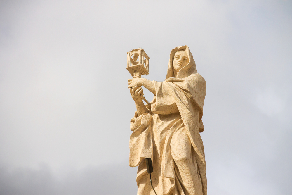 7 things to know about St. Clare of Assisi, the patron saint of television #Catholic On Aug. 11, the Catholic Church celebrates St. Clare of Assisi, one of the most beloved saints of the Middle Ages. Best known as the founder of the Poor Clares and a close friend of St. Francis of Assisi, Clareʼs life was marked by radical trust in God, profound Eucharistic devotion, and remarkable courage.Here are seven things to know about the woman whose witness continues to inspire Catholics more than 800 years later:1. She came from a wealthy noble family — but left everything behind.Clare was born in Assisi, Italy, on July 16, 1194, into one of the cityʼs most prominent noble families. As a young woman, she enjoyed a privileged upbringing and was expected to marry into another wealthy household.Instead, after hearing Francis — who is now known as St. Francis of Assisi — preach about living the Gospel with radical simplicity, Clare felt called to dedicate her life entirely to Christ. At age 18, she secretly left her family home on Palm Sunday night in 1212 to begin a new life of poverty.Her family attempted to bring her home by force, but Clare firmly refused and cut off her hair as a sign that she belonged to God alone.2. She founded the Poor Clares.With Francis' guidance, Clare established a community of women at the Church of San Damiano outside Assisi that would become known as the Poor Clares. She eventually became abbess and led the monastery for more than 40 years.Despite their similarities, Franciscans and Poor Clares have distinctive differences.The Franciscans, founded by St. Francis of Assisi in 1209, include men who are called to live the Gospel through poverty, fraternity, and service, often ministering in parishes, schools, missions, and charitable works around the world. The Poor Clares, founded by St. Clare of Assisi in 1212 with the guidance of St. Francis, are a contemplative order of women who live a cloistered life centered on prayer, the Eucharist, and community life.While both embrace the Franciscan ideals of simplicity and poverty, the Franciscans are primarily active in apostolic ministry, whereas the Poor Clares dedicate their lives to supporting the Church through prayer and contemplation.3. She was the first woman to write a rule for a religious order that received papal approval.One of St. Clareʼs most significant contributions to the Church was authoring the Rule for the Poor Clares. While many womenʼs religious communities of the time followed rules adapted from existing monastic traditions, Clare aimed to preserve the distinctive charism she had embraced alongside St. Francis.For decades, Clare resisted pressure from Church authorities to modify her communityʼs way of life by accepting property or financial endowments. Instead, she carefully composed a rule that reflected the Franciscan ideal while providing practical guidance for the sisters' communal life, prayer, governance, and observance of enclosure.On Aug. 9, 1253, just two days before Clareʼs death, Pope Innocent IV formally approved her rule, making her the first woman in the history of the Church to write a rule for a religious order that received papal approval. The rule remains the foundation of Poor Clare communities throughout the world and stands as a lasting testament to Clareʼs spiritual leadership and unwavering commitment to the Franciscan vision.4. She had an extraordinary devotion to the Eucharist.Perhaps no aspect of Clareʼs spirituality stands out more than her love for Jesus in the Blessed Sacrament. She spent countless hours in prayer before the Eucharist and encouraged her sisters to center their lives on Christʼs real presence.This Eucharistic devotion became especially evident during one of the most famous events of her life.One of the best-known stories about Clare occurred when invading Saracen mercenaries threatened the convent of San Damiano. Although seriously ill, Clare asked that the Blessed Sacrament be brought to her. Holding the monstrance before the attackers, she prayed for Godʼs protection, and the invaders fled.5. She is the patron saint of television.Near the end of Clare’s life, illness prevented her from attending Mass. According to tradition, she was miraculously able to see and hear the Christmas midnight Mass in 1252 being celebrated on the wall of her room in the convent. Because of this extraordinary supernatural event, Pope Pius XII declared her the patron saint of television in 1958.6. She and St. Francis shared one of the Churchʼs most remarkable friendships.The friendship between St. Clare and St. Francis of Assisi is one of the most enduring examples of holy companionship in Church history. Although Francis played a pivotal role in Clareʼs discernment and inspired her embrace of a life of poverty, their relationship was marked by mutual respect and a shared desire to follow Christ above all else. Francis entrusted Clare with establishing and leading the community at San Damiano, while Clare remained a steadfast guardian of the Franciscan charism, especially after Francis' death in 1226.Despite living separate vocations, the two maintained a deep spiritual bond rooted in prayer, humility, and service to the Gospel. More than eight centuries later, their example continues to inspire men and women to support one another in faithfully responding to Godʼs call.7. Her influence continues more than 800 years later.On Aug. 11, 1253, Clare died at the age of 59. She was canonized by Pope Alexander IV on Sept. 26, 1255.More than 800 years after she left her family home to follow Christ, St. Clareʼs witness continues to resonate with Catholics across the globe. Her unwavering trust in Godʼs providence, profound love for the Eucharist, and commitment to a life of simplicity remain as relevant today as they were in the 13th century.Through the monasteries of the Poor Clares, her spirit of contemplative prayer and poverty lives on, with thousands of religious sisters dedicating their lives to praying for the needs of the Church and the world.Today, there are approximately 20,000 Poor Clare nuns worldwide. They live in more than 500 monasteries in over 70 countries.