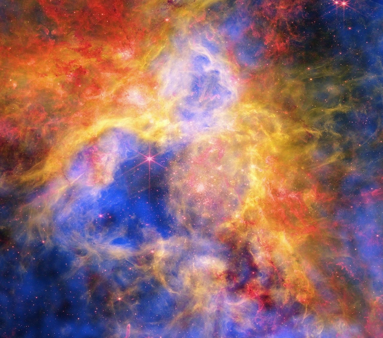 Colorful Collage of Tarantula Nebula – Like a collage made of layered sheets of colored cellophane, a vibrant new image layers observations of a famous star-forming nebula from NASA space telescopes. The resulting cosmic “craft” reveals new details about the star formation region known as 30 Doradus, or the Tarantula Nebula.