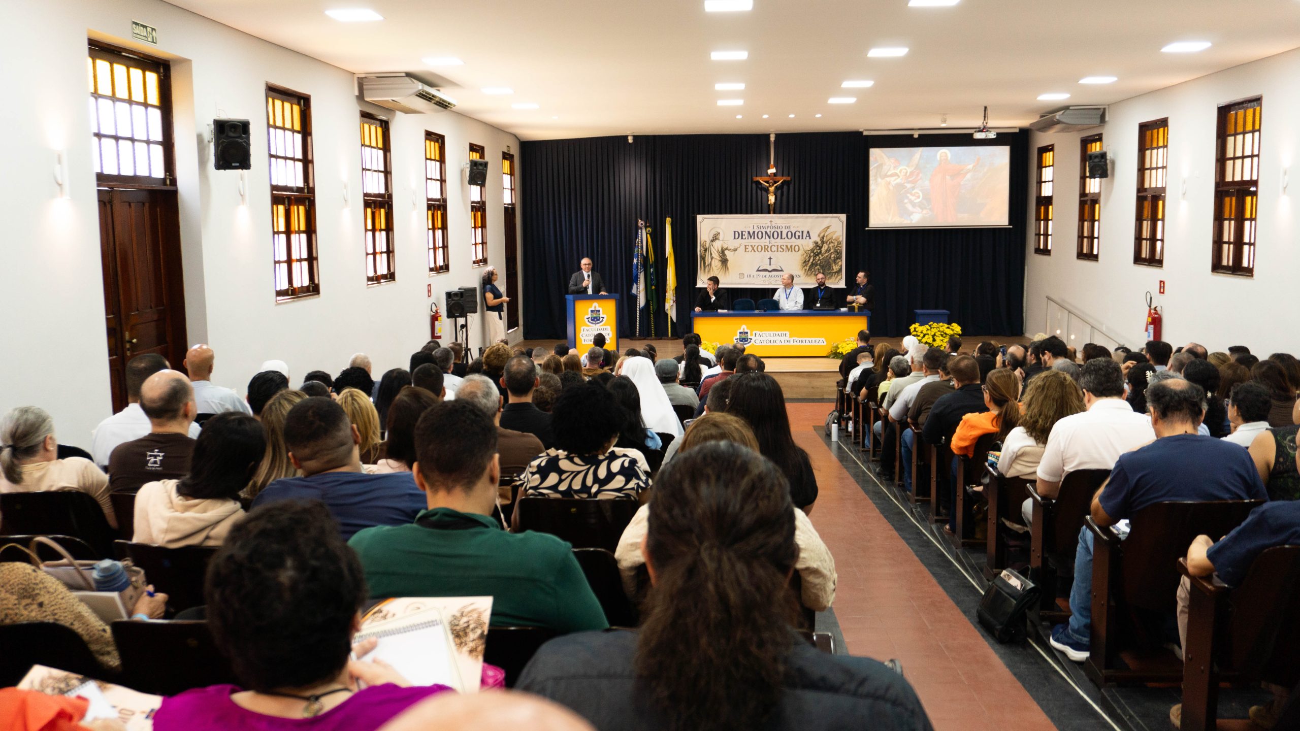 Symposium in Brazil addresses the devil’s existence as part of Catholic doctrine – #Catholic – A recent symposium in Fortaleza, Brazil, on demonology and exorcism “focused on the theological affirmation of the devil’s existence as part of Catholic doctrine,” Father Diogo Jairo Rebouças told ACI Digital, the Portuguese-language sister service of EWTN News. The priest is an exorcist for the Diocese of Limoeiro do Norte in Ceará state and coordinator of the gathering held Aug. 18–19.The symposium drew 240 participants, 76% of whom were laypeople. According to Rebouças, the event was open to this audience because its goal was not “to provide training for performing exorcisms” but rather “to reflect theologically in light of Scripture, tradition, and the magisterium on the reality of the angelic beings who chose damnation.”“We are convinced that this perspective is highly beneficial for deepening the faith of any and every Christian,” he said.The gathering was organized by Marian Community Oasis of Peace with the support of the Archdiocese of Fortaleza and took place in the central auditorium of the Catholic College of Fortaleza.Among the speakers were Bishop André Vital of Limoeiro do Norte in Ceará state; Father Pedro Paulo Alexandre, exorcist from the Archdiocese of Florianópolis in Santa Catarina state and member of the International Association of Exorcists (AIE, by its Portuguese acronym); Father Fellinto de Oliveira Britto, exorcist from the Diocese of Tianguá in Ceará state and a psychologist; Father Antônio Gomes Macedo Júnior, assistant exorcist; medical doctor Mauro Martins, also an assistant exorcist; and Father David Piter, exorcist from the Diocese of Quixadá in Ceará state and Rebouças.The lectures dealt, among other topics, with demonology in the Gospels and the liberating ministry of Christ, the Churchʼs guidelines for the ministry of exorcisms, the distinction between prayer for deliverance and exorcism, and the discernment between psychiatric pathologies and possible spiritual phenomena.Appointment by the bishop requiredAccording to Rebouças, the meeting presented the AIE’s guidelines to “make it clear that only priests duly appointed by the bishop may perform solemn exorcisms.”The priest stated that the guidance highlights “the Catholic Church’s commitment to pastoral ministry focused on discernment and mercy, rather than fear and sensationalism.”The symposium also addressed the necessary precautions during prayer for healing and deliverance, particularly regarding individuals who become highly distressed during such prayer.“Talks by both exorcists and mental health professionals addressed the need for prudence during prayer for healing and deliverance as it is frequently observed that highly suggestible individuals become emotionally destabilized during events that strongly appeal to the emotions,” Rebouças said.According to him, participants were instructed on “what procedure to follow when a member of the faithful experiences a crisis during [such prayer], in order to protect him from unnecessary exposure and avoid leading to hasty conclusions about possible activity by the evil one.”Moral certainty requiredAnother topic addressed was the discernment between possible extraordinary action by the devil and illnesses or other conditions of natural origin.“The guidelines for the exorcism ministry state that it is not permissible to perform an exorcism on a member of the faithful until the exorcist possesses moral certainty that the case involves extraordinary action by the evil one, rather than merely an illness or condition of natural origin,” Rebouças explained.Therefore, according to him, “mutual collaboration among the exorcist, family members, and healthcare professionals, especially mental health professionals, is extremely important.”“It is certainly not the exorcist’s role to provide a psychiatric diagnosis for the person nor is it the role of scientists to say whether the devil exists or not,” he said. “Each performs their respective role, observing signs of improvement or deterioration in the person throughout the process of accompaniment.”“Sometimes, a deeply devout but mentally ill believer refuses to take their medication until the priest comforts them by saying, ‘I will bless your medicines!’” he said. “And faith encourages the person to follow the treatment and therapies through which they find healing.”“An exorcist will never discourage a believer from making use of scientific therapeutic resources,” the priest added.“It is also not uncommon, in cases of genuine extraordinary demonic activity, for a doctor to tell the family: ‘We have done everything within our power!’ or even: ‘This defies scientific explanation!’” he said.“In this sense, the Church’s faith offers an explanation that addresses the human need regarding spiritual realities,” Rebouças said.The priest highlighted the importance of the training sessions for assistant exorcists offered by the Portuguese-language secretariat of the AIE in which laypeople and healthcare professionals may participate. The next training session will take place Nov. 27–29 at St. Benedict Monastery in Rio de Janeiro.This story was first published by ACI Digital, the Portuguese-language sister service of EWTN News. It has been translated and adapted by EWTN News English.