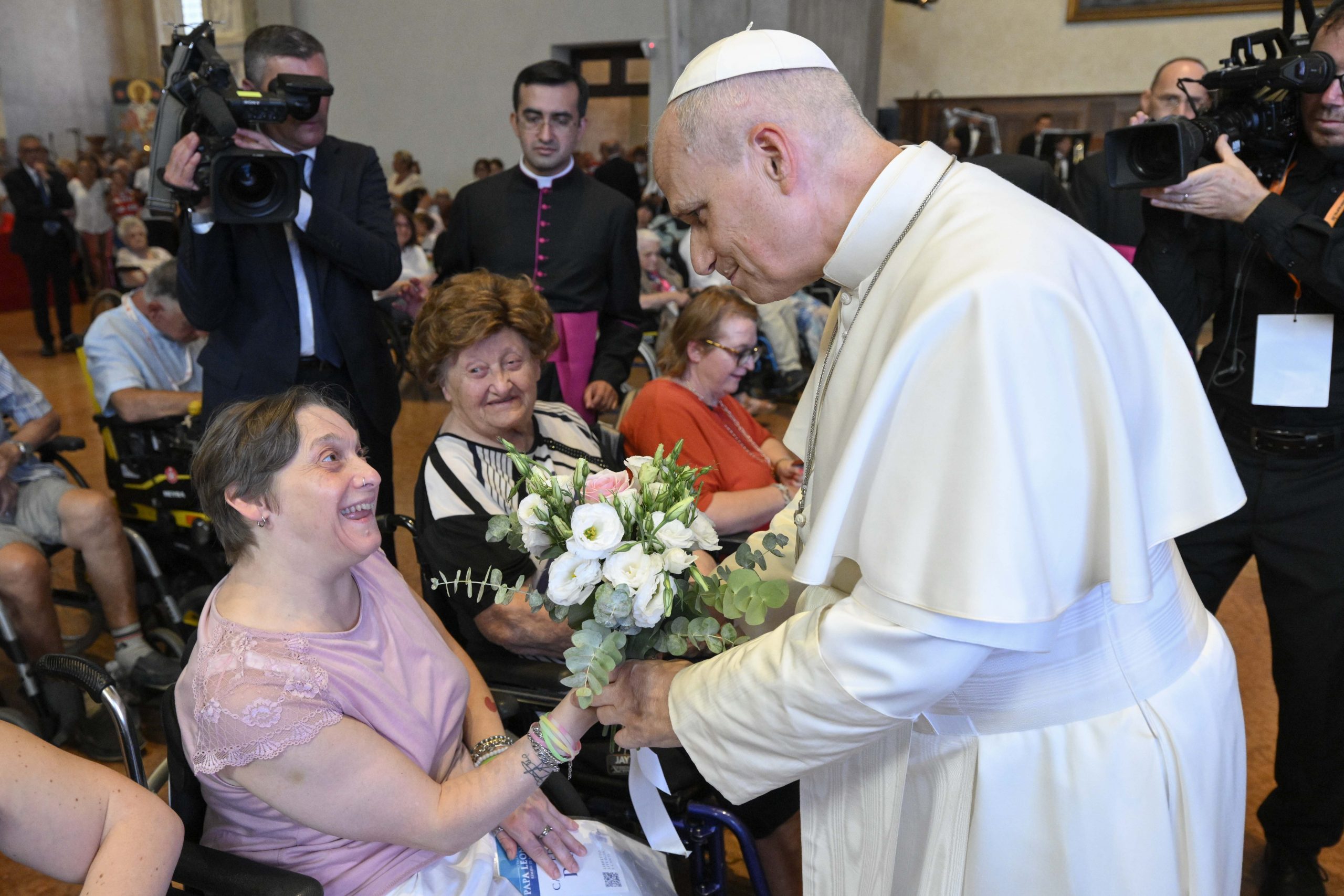 ‘You are home’: Pope Leo XIV meets with sick, disabled residents at Rimini #Catholic Pope Leo XIV met with sick and disabled residents of the city of Rimini, Italy on Aug. 22, urging them to “follow the Lord by taking an active part in the life of the Church.” The meeting came at the end of a whirlwind day of travel for the pope, who visited the tiny landlocked country of San Marino before making an appearance at the 47th Meeting for Friendship Among the Peoples in Rimini. 
 
 Pope Leo XIV is handed flowers by a woman in a wheelchair at Rimini Cathedral, Aug. 22, 2026, during a meeting with people suffering from illnesses and disabilities. | Credit: Vatican Media
 
 In his meeting with those suffering from illness and disabilities, which took place at Rimini Cathedral, the pope said the ancient church signified to the sick and poor: “You are home.”Jesus, the Holy Father said, worked to “heal [sick people] and restore to them a life worthy of their dignity.” 
 
 Pope Leo XIV speaks at Rimini Cathedral, Aug. 22, 2026, during a meeting with people suffering from illnesses and disabilities. | Credit: Vatican Media
 
 He urged the assembly to take part in Church life “in the parish, in associations, and in places of welcome and service.”The pope subsequently said Mass at the Port of Rimini, where in his homily he told the faithful that “everything we are and have is a gift from God.”He said every baptized Christian is oriented toward “embracing, gathering, welcoming, liberating, forgiving [and] emancipating anyone who is a prisoner of sin and its consequence.”Referring to St. Paul’s Letter to the Romans, the pope said: “God is simple, because he is pure charity, and calls us also to love with a heart similar to his, conforming our ways to his ways and our thoughts to his thoughts.”