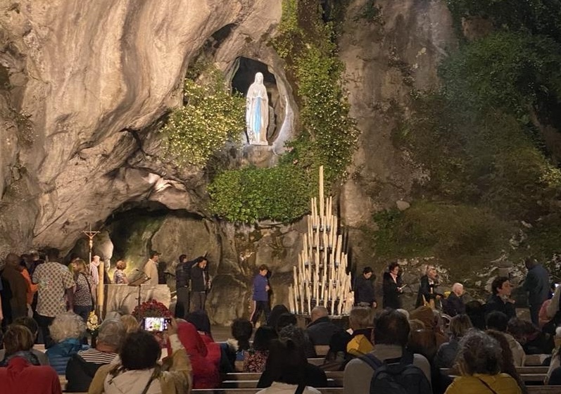 From foster care to Lourdes: Young convert leaves job to see pope, embrace monastic life – #Catholic – LOURDES, France — The exceptional fervor that marked the pope’s visit to Paris — the first stage of his Sept. 25–28 apostolic journey to France — should show no sign of waning in Lourdes, where tens of thousands of faithful are expected to gather around the famous grotto of Massabielle when Leo XIV comes to pray there on the evening of Sept. 26, ahead of an outdoor Mass on the sanctuary’s meadow and the traditional torchlight procession the following day. Among them will be a 27-year-old woman who will attend alongside a group of Cistercian nuns, hoping the visit will confirm the call to contemplative life she has felt since returning to the faith during the COVID-19 crisis. It is no coincidence that Yohanna, a sign-language interpreter for deaf people, has chosen Lourdes to mark this new beginning after years of volunteering with people with disabilities. It is a few dozen miles from here, at the Abbey of Sainte-Marie de Boulaur, one of the strongholds of monastic renewal in France, that her vocation took shape. And it is to join this community as an aspirant that she quit her job in Paris, just in time not to miss the Holy Father’s visit.Her story reflects a broader generational movement in France, where adult baptisms reached a new record this year, driven largely by young adults.
The Shrine of Our Lady of Lourdes. | Credit: Solene Tadie
‘I wanted to give God everything’But Yohanna’s story is a singular testament to divine grace. Placed in foster care at the age of 4, she grew up far from any religious practice in a life marked early on by bereavement and solitude.Like so many of her generation, she first went looking for answers in the spiritual movements close to the New Age that flourish among young French people — an exploration that left its mark, literally, in the tattoos she still carries. She evokes these wanderings today with a smile rather than regret, for it was through them, she believes, that she eventually found her way back to God.That way opened in the spring of 2020, in a university residence emptied by the first COVID-19 lockdown. “All the students had left, and it felt a bit like the end of the world,” she recalled. “I had nothing; I had no one. And suddenly there was this thought of God that took hold of me. I became really eager to know more about him.”She began learning how to pray through online resources and quickly made prayer part of her daily life. Once the lockdown was lifted, she developed a taste for stepping into every church she encountered to pray alone, while avoiding Masses, since she didn’t know any of the customs. The turning point came in 2023, when she moved to Paris and walked into a church on a weekday, just as a Mass was beginning.“I didn’t even know there was a consecration, although it is the heart of the Catholic Mass. But I spent that whole celebration crying at the back of the church,” she remembered. “And at the end I said to the Lord: OK, I’ve understood. Now I want to give you everything, really everything, my whole life. Do what you want with me. And from that moment on, everything changed.” After settling in a parish in Paris’s 10th arrondissement, she undertook a period of catechetical formation and received the sacrament of confirmation.During the National Pilgrimage each August, she serves as an interpreter for deaf-blind pilgrims — an experience that transformed her understanding of the sanctuary. “The real miracle of Lourdes,” she said, “is perhaps simply that we all end up together.”Her conversion was followed by the call to consecrated life almost immediately, but she was determined not to rush her decision, having been warned that new converts “might be very enthusiastic and immediately think of consecrated life, only to give it up quickly.”
The Grotto at the Shrine of Our Lady of Lourdes. | Credit: Solene Tadie
An unexpected callGuided by her parish priest and the vocations service of the Archdiocese of Paris, she began discerning with apostolic sisters, cloistered life being the last thing on her mind. “Given my personal background, I had enormous clichés about monastic life,” she said. “I imagined all sorts of old-fashioned things.”It was in the middle of a difficult university year, at the end of December 2024, that she first went to the Cistercian abbey of Boulaur, simply because she “had always heard that monasteries were a good place to rest and get some air.” She has returned every holiday since. When the sisters offered her a stay inside the enclosure, she accepted with the thought that it would only confirm her prejudices.“I thought that going inside the cloister for the first time would help me understand that this was not my path at all, and that would settle it,” she said. “But when I experienced the cloister for the first time, it was incredible. I felt completely in my place.”“The Lord knows us better than we know ourselves,” she continued. “Sometimes he leads us to things that at first seem absurd, and afterward you realize that it fits perfectly.”At the 2025 Jubilee of Youth in Rome, she encountered the universal Church for the first time among thousands of young people “so different from each other, and all there for the Lord.” That experience now shapes her expectations for Leo’s visit to a France witnessing record numbers of adult baptisms. Reflecting on the pope’s forthcoming visit to Lourdes, which Bishop Jean-Marc Micas of Tarbes and Lourdes has described as that of “a simple pilgrim,” she said: “Pope Leo knows what is happening in our country, and I’m sure his words will help us on our way.” The official program already includes a special prayer for France, asking the Virgin Mary for the renewal of Christian families and the flourishing of vocations, “especially priestly and religious.”Yohanna’s own vocation initially alarmed her foster parents. But faced with her perseverance and joy, they agreed to drive her to Boulaur themselves, giving them an opportunity to meet the sisters and discover the life she is preparing to embrace. From there, they will travel together to Lourdes for the pope’s visit.“It will be a chance for them to meet the sisters and to see what a monastery really is, not just what people imagine,” she said. “That’s already a big step.”Her aspirancy, the first step on the long road to the novitiate, is to last until June. She said her heart is “completely open” to what it will reveal. “If God calls me there, I’ll be so happy that I’ll offer him a big yes, with all my heart.” From foster care to Lourdes: Young convert leaves job to see pope, embrace monastic life – #Catholic – LOURDES, France — The exceptional fervor that marked the pope’s visit to Paris — the first stage of his Sept. 25–28 apostolic journey to France — should show no sign of waning in Lourdes, where tens of thousands of faithful are expected to gather around the famous grotto of Massabielle when Leo XIV comes to pray there on the evening of Sept. 26, ahead of an outdoor Mass on the sanctuary’s meadow and the traditional torchlight procession the following day. Among them will be a 27-year-old woman who will attend alongside a group of Cistercian nuns, hoping the visit will confirm the call to contemplative life she has felt since returning to the faith during the COVID-19 crisis. It is no coincidence that Yohanna, a sign-language interpreter for deaf people, has chosen Lourdes to mark this new beginning after years of volunteering with people with disabilities. It is a few dozen miles from here, at the Abbey of Sainte-Marie de Boulaur, one of the strongholds of monastic renewal in France, that her vocation took shape. And it is to join this community as an aspirant that she quit her job in Paris, just in time not to miss the Holy Father’s visit.Her story reflects a broader generational movement in France, where adult baptisms reached a new record this year, driven largely by young adults.
The Shrine of Our Lady of Lourdes. | Credit: Solene Tadie
‘I wanted to give God everything’But Yohanna’s story is a singular testament to divine grace. Placed in foster care at the age of 4, she grew up far from any religious practice in a life marked early on by bereavement and solitude.Like so many of her generation, she first went looking for answers in the spiritual movements close to the New Age that flourish among young French people — an exploration that left its mark, literally, in the tattoos she still carries. She evokes these wanderings today with a smile rather than regret, for it was through them, she believes, that she eventually found her way back to God.That way opened in the spring of 2020, in a university residence emptied by the first COVID-19 lockdown. “All the students had left, and it felt a bit like the end of the world,” she recalled. “I had nothing; I had no one. And suddenly there was this thought of God that took hold of me. I became really eager to know more about him.”She began learning how to pray through online resources and quickly made prayer part of her daily life. Once the lockdown was lifted, she developed a taste for stepping into every church she encountered to pray alone, while avoiding Masses, since she didn’t know any of the customs. The turning point came in 2023, when she moved to Paris and walked into a church on a weekday, just as a Mass was beginning.“I didn’t even know there was a consecration, although it is the heart of the Catholic Mass. But I spent that whole celebration crying at the back of the church,” she remembered. “And at the end I said to the Lord: OK, I’ve understood. Now I want to give you everything, really everything, my whole life. Do what you want with me. And from that moment on, everything changed.” After settling in a parish in Paris’s 10th arrondissement, she undertook a period of catechetical formation and received the sacrament of confirmation.During the National Pilgrimage each August, she serves as an interpreter for deaf-blind pilgrims — an experience that transformed her understanding of the sanctuary. “The real miracle of Lourdes,” she said, “is perhaps simply that we all end up together.”Her conversion was followed by the call to consecrated life almost immediately, but she was determined not to rush her decision, having been warned that new converts “might be very enthusiastic and immediately think of consecrated life, only to give it up quickly.”
The Grotto at the Shrine of Our Lady of Lourdes. | Credit: Solene Tadie
An unexpected callGuided by her parish priest and the vocations service of the Archdiocese of Paris, she began discerning with apostolic sisters, cloistered life being the last thing on her mind. “Given my personal background, I had enormous clichés about monastic life,” she said. “I imagined all sorts of old-fashioned things.”It was in the middle of a difficult university year, at the end of December 2024, that she first went to the Cistercian abbey of Boulaur, simply because she “had always heard that monasteries were a good place to rest and get some air.” She has returned every holiday since. When the sisters offered her a stay inside the enclosure, she accepted with the thought that it would only confirm her prejudices.“I thought that going inside the cloister for the first time would help me understand that this was not my path at all, and that would settle it,” she said. “But when I experienced the cloister for the first time, it was incredible. I felt completely in my place.”“The Lord knows us better than we know ourselves,” she continued. “Sometimes he leads us to things that at first seem absurd, and afterward you realize that it fits perfectly.”At the 2025 Jubilee of Youth in Rome, she encountered the universal Church for the first time among thousands of young people “so different from each other, and all there for the Lord.” That experience now shapes her expectations for Leo’s visit to a France witnessing record numbers of adult baptisms. Reflecting on the pope’s forthcoming visit to Lourdes, which Bishop Jean-Marc Micas of Tarbes and Lourdes has described as that of “a simple pilgrim,” she said: “Pope Leo knows what is happening in our country, and I’m sure his words will help us on our way.” The official program already includes a special prayer for France, asking the Virgin Mary for the renewal of Christian families and the flourishing of vocations, “especially priestly and religious.”Yohanna’s own vocation initially alarmed her foster parents. But faced with her perseverance and joy, they agreed to drive her to Boulaur themselves, giving them an opportunity to meet the sisters and discover the life she is preparing to embrace. From there, they will travel together to Lourdes for the pope’s visit.“It will be a chance for them to meet the sisters and to see what a monastery really is, not just what people imagine,” she said. “That’s already a big step.”Her aspirancy, the first step on the long road to the novitiate, is to last until June. She said her heart is “completely open” to what it will reveal. “If God calls me there, I’ll be so happy that I’ll offer him a big yes, with all my heart.”