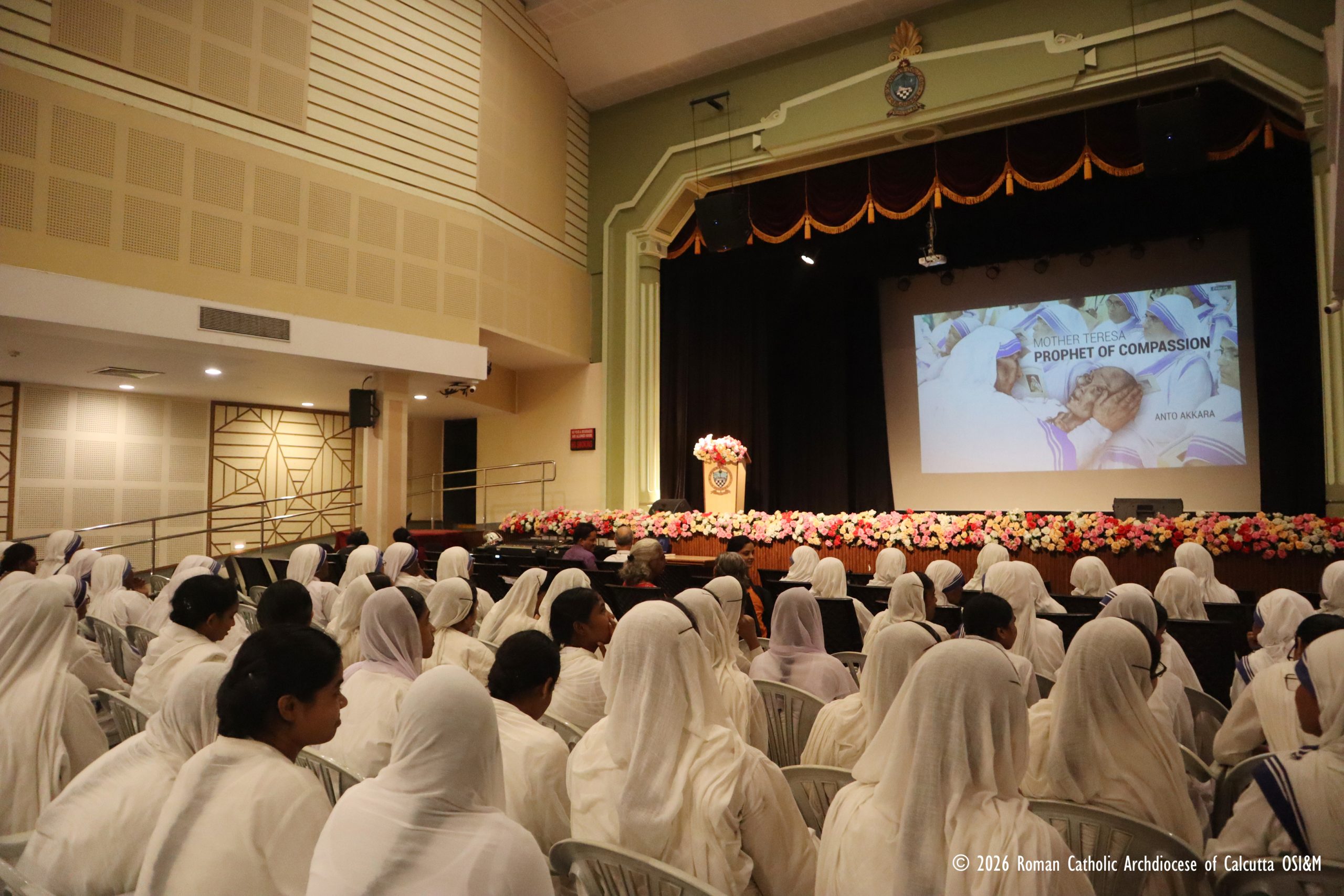 Mother Teresa documentary premieres in Kolkata on her feast day – #Catholic – An international documentary tracing the life, legacy, and “prophetic path of compassion” of St. Teresa of Kolkata premiered Saturday on her feast day in Kolkata, India, drawing more than 200 people, including dozens of Missionaries of Charity (MC) nuns and novices.“Mother Teresa – Prophet of Compassion,” produced by journalist and author Anto Akkara, was screened at the Auditorium of St Xavier’s College, Park Street, with Archbishop Elias Frank of Kolkata presiding over the premiere.In his introductory remarks, the archbishop praised Akkara’s determination to bring lesser-known aspects of Mother Teresa’s life and work to a global audience.“We are here, dear friends, not just to see what he has done, but to be inspired by Mother’s work,” Frank said, commending the journalist’s “passion” for making Mother Teresa known through the documentary.“There are things that we may not even know yet,” Frank said, pointing to the film’s journalistic examination of events surrounding the Missionaries of Charity.
Archbishop Elias Frank of Kolkata sits beside journalist and author Anto Akkara during the premiere of the new documentary “Mother Teresa – Prophet of Compassion,” at the Auditorium of St Xavier’s College on Sept. 5, 2026. | Credit: Farrell Shah, Communications Director, Calcutta Archdiocese
Akkara, who is also a contributor to EWTN News, said his association with Mother Teresa began in 1995, when, at the age of 33, he was granted what he described as a “comprehensive” interview with her.“Since then, I pursued the Missionaries of Charity on crucial occasions, frequenting Kolkata often from the funeral of the Mother in 1997,” he said. Akkara has visited Kolkata more than two dozen times for international reporting.He said he proposed the documentary as the Missionaries of Charity approached their 75th anniversary, and the congregation agreed to the project. Atmadarshan TV, Indore, provided support for the production.The new 66-minute documentary builds on an earlier version produced for the congregation’s 75th Foundation Day in October 2025. Akkara subsequently reworked the film, adding more than a dozen new episodes and international accounts.The documentary traces Mother Teresa’s journey from her early work in India to the worldwide expansion of the Missionaries of Charity, highlighting episodes in Patna in 1948, Jharkhand in 1959, and New Delhi in 1961.It also examines the congregation’s work amid conflict, including the killings of MC sisters in Yemen in 1998 and 2016, the expulsion of the congregation from Nicaragua, and the decision of sisters to remain in Gaza and Ukraine amid bombardment.
Journalist and author Anto Akkara speaks at the premiere of his new documentary, “Mother Teresa – Prophet of Compassion,” at the Auditorium of St Xavier’s College on Sept. 5, 2026., hosted by the Archdiocese of Kolkata. | Credit: Farrell Shah, Communications Director, Calcutta Archdiocese| Credit: Farrell Shah, Communications Director, Calcutta Archdiocese
Among those featured in the film is legendary photographer Raghu Rai. The documentary also recalls appreciation expressed for Mother Teresa by Prime Minister Jawaharlal Nehru when inaugurating a new Shishu Bhavan building in New Delhi.Akkara said the film challenges allegations that Mother Teresa’s charitable work was primarily a vehicle for religious conversion and highlights her service to people living in extreme poverty, children, orphans, people with disabilities and mental illness, and those affected by leprosy.Several lesser-known stories included in the film illustrate the breadth of her work. The documentary notes that the distinctive blue-striped white cotton saris worn by MC sisters are woven by people affected by leprosy at the congregation’s Titagarh centre, dedicated to Mahatma Gandhi.
Archbishop Elias Frank speaks at the premiere of the new documentary “Mother Teresa – Prophet of Compassion,” at the Auditorium of St Xavier’s College on Sept. 5, 2026, hosted by the Archdiocese of Kolkata. | Credit: Farrell Shah, Communications Director, Calcutta Archdiocese
The film also recounts Mother Teresa’s efforts to persuade the Indian Air Force to plant trees at the MC leprosy home in Delhi and her decision to decline a papal invitation to the 1993 World Youth Day in Denver so that she could travel to Borduria in Arunachal Pradesh to intervene against the killing of infants born with deformities.Another story describes a raffle organized to raise funds for the leprosy hospital at Shanti Nagar by selling a popemobile reportedly donated to Mother Teresa following the 1964 World Eucharistic Congress in Mumbai.The documentary also recalls Mother Teresa’s request that the Nobel Committee cancel the customary banquet accompanying the Nobel Prize and use the money instead to help orphans in Kolkata.The film highlights the respect Mother Teresa received across religious and political lines, including appreciation from former President A.P.J. Abdul Kalam and former Prime Ministers Inder Kumar Gujral and Atal Bihari Vajpayee.The film also recounts Mother Teresa’s relationship with Jyoti Basu, the longtime Marxist chief minister of West Bengal. Basu, a friend of Mother Teresa, reportedly once remarked: “This lady makes me a bad Marxist, making me believe in Godliness.”
Over 200 people, including many Missionaries of Charity nuns and novices, attended the premiere of the new documentary “Mother Teresa – Prophet of Compassion” on Sept. 5, 2026, hosted by the Archdiocese of Kolkata. | Credit: Farrell Shah, Communications Director, Calcutta Archdiocese
In another example of her outreach across religious boundaries, Mother Teresa named an MC centre near Ranchi “Radharani Convent” in honor of a Hindu woman who donated land for a leprosy home in 1973.Born Anjezë Gonxhe Bojaxhiu in 1910 in present-day North Macedonia, Mother Teresa came to India in 1929 as a Loreto Sister and founded the Missionaries of Charity in 1950. The congregation has since expanded across the world, serving some of the poorest and most vulnerable communities. The new documentary presents that expansion as the story of a movement that seeks to “globalize compassion and care” while remaining rooted in the founder’s commitment to the destitute. Mother Teresa documentary premieres in Kolkata on her feast day – #Catholic – An international documentary tracing the life, legacy, and “prophetic path of compassion” of St. Teresa of Kolkata premiered Saturday on her feast day in Kolkata, India, drawing more than 200 people, including dozens of Missionaries of Charity (MC) nuns and novices.“Mother Teresa – Prophet of Compassion,” produced by journalist and author Anto Akkara, was screened at the Auditorium of St Xavier’s College, Park Street, with Archbishop Elias Frank of Kolkata presiding over the premiere.In his introductory remarks, the archbishop praised Akkara’s determination to bring lesser-known aspects of Mother Teresa’s life and work to a global audience.“We are here, dear friends, not just to see what he has done, but to be inspired by Mother’s work,” Frank said, commending the journalist’s “passion” for making Mother Teresa known through the documentary.“There are things that we may not even know yet,” Frank said, pointing to the film’s journalistic examination of events surrounding the Missionaries of Charity.
Archbishop Elias Frank of Kolkata sits beside journalist and author Anto Akkara during the premiere of the new documentary “Mother Teresa – Prophet of Compassion,” at the Auditorium of St Xavier’s College on Sept. 5, 2026. | Credit: Farrell Shah, Communications Director, Calcutta Archdiocese
Akkara, who is also a contributor to EWTN News, said his association with Mother Teresa began in 1995, when, at the age of 33, he was granted what he described as a “comprehensive” interview with her.“Since then, I pursued the Missionaries of Charity on crucial occasions, frequenting Kolkata often from the funeral of the Mother in 1997,” he said. Akkara has visited Kolkata more than two dozen times for international reporting.He said he proposed the documentary as the Missionaries of Charity approached their 75th anniversary, and the congregation agreed to the project. Atmadarshan TV, Indore, provided support for the production.The new 66-minute documentary builds on an earlier version produced for the congregation’s 75th Foundation Day in October 2025. Akkara subsequently reworked the film, adding more than a dozen new episodes and international accounts.The documentary traces Mother Teresa’s journey from her early work in India to the worldwide expansion of the Missionaries of Charity, highlighting episodes in Patna in 1948, Jharkhand in 1959, and New Delhi in 1961.It also examines the congregation’s work amid conflict, including the killings of MC sisters in Yemen in 1998 and 2016, the expulsion of the congregation from Nicaragua, and the decision of sisters to remain in Gaza and Ukraine amid bombardment.
Journalist and author Anto Akkara speaks at the premiere of his new documentary, “Mother Teresa – Prophet of Compassion,” at the Auditorium of St Xavier’s College on Sept. 5, 2026., hosted by the Archdiocese of Kolkata. | Credit: Farrell Shah, Communications Director, Calcutta Archdiocese| Credit: Farrell Shah, Communications Director, Calcutta Archdiocese
Among those featured in the film is legendary photographer Raghu Rai. The documentary also recalls appreciation expressed for Mother Teresa by Prime Minister Jawaharlal Nehru when inaugurating a new Shishu Bhavan building in New Delhi.Akkara said the film challenges allegations that Mother Teresa’s charitable work was primarily a vehicle for religious conversion and highlights her service to people living in extreme poverty, children, orphans, people with disabilities and mental illness, and those affected by leprosy.Several lesser-known stories included in the film illustrate the breadth of her work. The documentary notes that the distinctive blue-striped white cotton saris worn by MC sisters are woven by people affected by leprosy at the congregation’s Titagarh centre, dedicated to Mahatma Gandhi.
Archbishop Elias Frank speaks at the premiere of the new documentary “Mother Teresa – Prophet of Compassion,” at the Auditorium of St Xavier’s College on Sept. 5, 2026, hosted by the Archdiocese of Kolkata. | Credit: Farrell Shah, Communications Director, Calcutta Archdiocese
The film also recounts Mother Teresa’s efforts to persuade the Indian Air Force to plant trees at the MC leprosy home in Delhi and her decision to decline a papal invitation to the 1993 World Youth Day in Denver so that she could travel to Borduria in Arunachal Pradesh to intervene against the killing of infants born with deformities.Another story describes a raffle organized to raise funds for the leprosy hospital at Shanti Nagar by selling a popemobile reportedly donated to Mother Teresa following the 1964 World Eucharistic Congress in Mumbai.The documentary also recalls Mother Teresa’s request that the Nobel Committee cancel the customary banquet accompanying the Nobel Prize and use the money instead to help orphans in Kolkata.The film highlights the respect Mother Teresa received across religious and political lines, including appreciation from former President A.P.J. Abdul Kalam and former Prime Ministers Inder Kumar Gujral and Atal Bihari Vajpayee.The film also recounts Mother Teresa’s relationship with Jyoti Basu, the longtime Marxist chief minister of West Bengal. Basu, a friend of Mother Teresa, reportedly once remarked: “This lady makes me a bad Marxist, making me believe in Godliness.”
Over 200 people, including many Missionaries of Charity nuns and novices, attended the premiere of the new documentary “Mother Teresa – Prophet of Compassion” on Sept. 5, 2026, hosted by the Archdiocese of Kolkata. | Credit: Farrell Shah, Communications Director, Calcutta Archdiocese
In another example of her outreach across religious boundaries, Mother Teresa named an MC centre near Ranchi “Radharani Convent” in honor of a Hindu woman who donated land for a leprosy home in 1973.Born Anjezë Gonxhe Bojaxhiu in 1910 in present-day North Macedonia, Mother Teresa came to India in 1929 as a Loreto Sister and founded the Missionaries of Charity in 1950. The congregation has since expanded across the world, serving some of the poorest and most vulnerable communities. The new documentary presents that expansion as the story of a movement that seeks to “globalize compassion and care” while remaining rooted in the founder’s commitment to the destitute.
