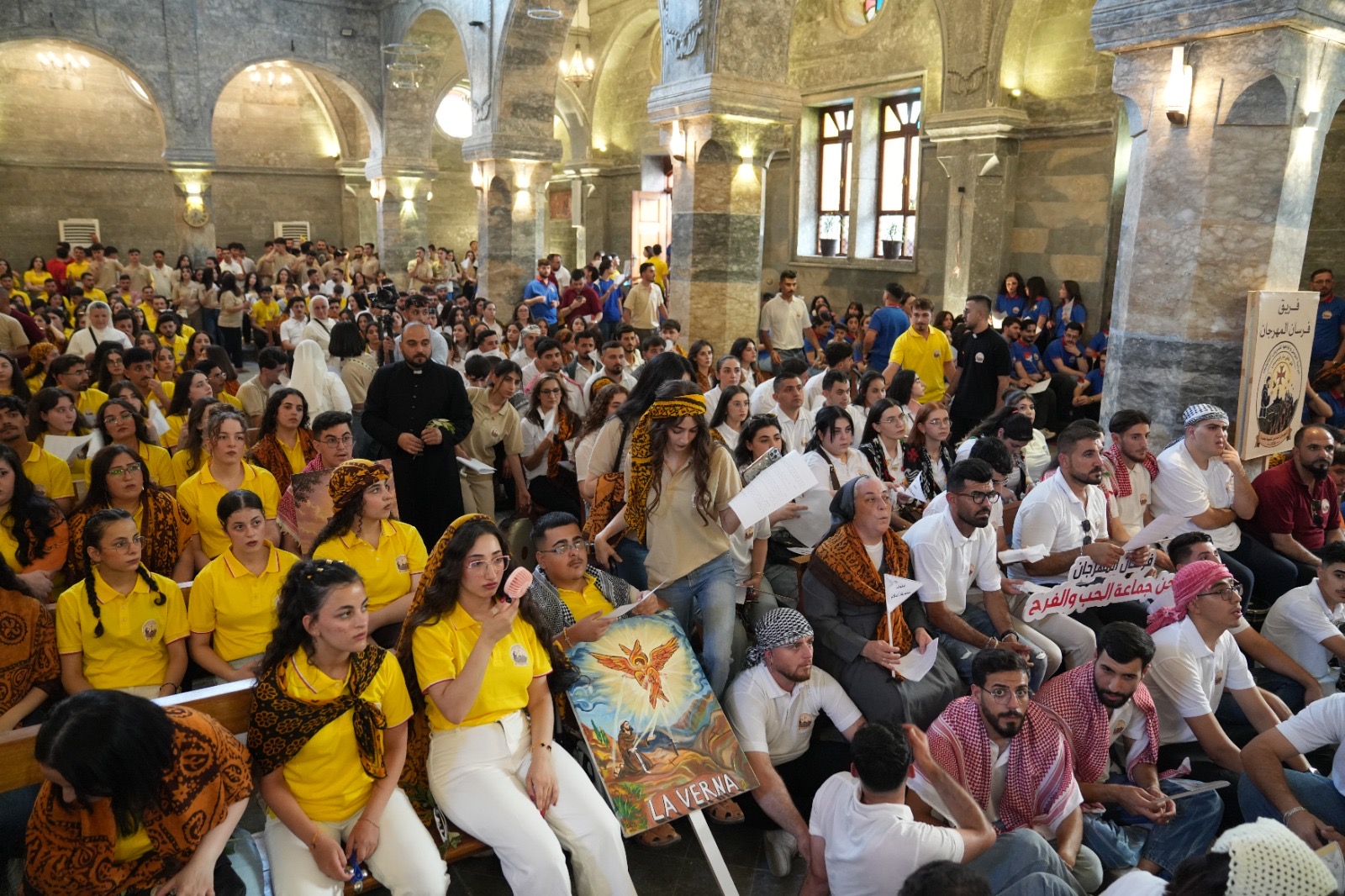 Nearly 700 young Christians gather in Iraq for Baghdeda Youth Festival – #Catholic – The sixth Baghdeda Youth Festival concluded Saturday, Sept. 12, with a large faith procession that brought together nearly 700 young men and women, led by Bishop Benedictus Younan Hanno of the Syriac Catholic Diocese of Mosul and its dependencies, along with former diocesan bishops Yohanna Boutros Moshe and Georges al-Qass Moussa, priests, religious men and women, and thousands of faithful.The procession, which organizers called the “Hosanna Procession,” began at the Cathedral of the Immaculate Conception in Baghdeda, also widely known as Qaraqosh — a predominantly Christian town on Iraq’s Nineveh Plains. Participants followed the traditional Palm Sunday procession route toward St. John Church.
The sixth Baghdeda Youth Festival concluded Saturday, Sept. 12, 2026, with a large faith procession that brought together nearly 700 young men and women, led by Bishop Benedictus Younan Hanno of the Syriac Catholic Diocese of Mosul and its dependencies, along with former diocesan bishops Yohanna Boutros Moshe and Georges al-Qass Moussa, priests, religious men and women, and thousands of faithful. | Credit: Ragheed Nenwaya/ACI MENA
Along the way, young people and other faithful prayed, sang hymns, and chanted while carrying olive branches as a symbol of peace. The procession concluded with the “Service of the Cross — Teshmeshta,” a prayer service from the Syriac tradition, followed by the lighting of the festival torch.Before setting out from the cathedral, participants attended a spiritual conference titled “St. Francis: A Living Model for Our Young People in Living Hope,” presented by Dominican Father Nuwairan Nasser. He encouraged the young people to follow the example of St. Francis of Assisi, seeking to embody his spiritual values in their daily lives and to live more deeply the meaning of the festival’s theme.‘In the footsteps of St. Francis’The festival began Thursday under the theme “In the Footsteps of St. Francis.” The opening program included a spiritual reflection by Hanno titled “Leave Everything That Makes You Lose Yourself.”The bishop stressed the importance of understanding Christian freedom as a free response of obedience to God rather than as freedom without accountability or responsibility. His reflection drew on the festival’s theme and the life of St. Francis.Participants then divided into groups for pilgrimages and prayer at several churches in Baghdeda, including St. Ephrem the Syriac Church, Sts. Behnam and Sarah Church, St. James the Mutilated Church, St. John the Baptist Church, and St. Joseph Church.
Bishop Benedictus Younan Hanno of the Syriac Catholic Diocese of Mosul and its dependencies hosted and led the sixth Baghdeda Youth Festival in northern Iraq on Sept. 12, 2026. | Credit: Ragheed Nenwaya/ACI MENA
Mosul welcomes Baghdeda’s young ChristiansThe festival’s second day included visits to restored churches belonging to the diocese in Mosul, a city where the Christian community suffered severe persecution and displacement during the occupation of the Islamic State group.The young people began at St. Thomas Church and continued to the Church of the Immaculate Conception, both in Mosul’s Old City, before concluding at Our Lady of the Annunciation Church on the city’s eastern side.
The sixth Baghdeda Youth Festival concluded Saturday, Sept. 12, 2026, with a large faith procession that brought together nearly 700 young men and women, led by Bishop Benedictus Younan Hanno of the Syriac Catholic Diocese of Mosul and its dependencies, along with former diocesan bishops Yohanna Boutros Moshe and Georges al-Qass Moussa, priests, religious men and women, and thousands of faithful. | Credit: Ragheed Nenwaya/ACI MENA
Residents greeted the crowds of young Christians and welcomed what organizers described as “the renewed Christian presence in the community’s historic homeland.”The day also featured a spiritual conference titled “Forgive So That You May Be Free,” presented by Chorbishop Emmanuel Kallo, the bishop’s special vicar and official responsible for the Syriac Catholic churches in Mosul.Kallo reflected on the Christian understanding of forgiveness and explained how forgiving others can help free a person from the burden and pain caused by wrongdoing.The young people also participated in Eucharistic adoration at Our Lady of the Annunciation Church.This story was first published by ACI MENA, the Arabic-language sister service of EWTN News. It has been translated and adapted by EWTN News English. Nearly 700 young Christians gather in Iraq for Baghdeda Youth Festival – #Catholic – The sixth Baghdeda Youth Festival concluded Saturday, Sept. 12, with a large faith procession that brought together nearly 700 young men and women, led by Bishop Benedictus Younan Hanno of the Syriac Catholic Diocese of Mosul and its dependencies, along with former diocesan bishops Yohanna Boutros Moshe and Georges al-Qass Moussa, priests, religious men and women, and thousands of faithful.The procession, which organizers called the “Hosanna Procession,” began at the Cathedral of the Immaculate Conception in Baghdeda, also widely known as Qaraqosh — a predominantly Christian town on Iraq’s Nineveh Plains. Participants followed the traditional Palm Sunday procession route toward St. John Church.
The sixth Baghdeda Youth Festival concluded Saturday, Sept. 12, 2026, with a large faith procession that brought together nearly 700 young men and women, led by Bishop Benedictus Younan Hanno of the Syriac Catholic Diocese of Mosul and its dependencies, along with former diocesan bishops Yohanna Boutros Moshe and Georges al-Qass Moussa, priests, religious men and women, and thousands of faithful. | Credit: Ragheed Nenwaya/ACI MENA
Along the way, young people and other faithful prayed, sang hymns, and chanted while carrying olive branches as a symbol of peace. The procession concluded with the “Service of the Cross — Teshmeshta,” a prayer service from the Syriac tradition, followed by the lighting of the festival torch.Before setting out from the cathedral, participants attended a spiritual conference titled “St. Francis: A Living Model for Our Young People in Living Hope,” presented by Dominican Father Nuwairan Nasser. He encouraged the young people to follow the example of St. Francis of Assisi, seeking to embody his spiritual values in their daily lives and to live more deeply the meaning of the festival’s theme.‘In the footsteps of St. Francis’The festival began Thursday under the theme “In the Footsteps of St. Francis.” The opening program included a spiritual reflection by Hanno titled “Leave Everything That Makes You Lose Yourself.”The bishop stressed the importance of understanding Christian freedom as a free response of obedience to God rather than as freedom without accountability or responsibility. His reflection drew on the festival’s theme and the life of St. Francis.Participants then divided into groups for pilgrimages and prayer at several churches in Baghdeda, including St. Ephrem the Syriac Church, Sts. Behnam and Sarah Church, St. James the Mutilated Church, St. John the Baptist Church, and St. Joseph Church.
Bishop Benedictus Younan Hanno of the Syriac Catholic Diocese of Mosul and its dependencies hosted and led the sixth Baghdeda Youth Festival in northern Iraq on Sept. 12, 2026. | Credit: Ragheed Nenwaya/ACI MENA
Mosul welcomes Baghdeda’s young ChristiansThe festival’s second day included visits to restored churches belonging to the diocese in Mosul, a city where the Christian community suffered severe persecution and displacement during the occupation of the Islamic State group.The young people began at St. Thomas Church and continued to the Church of the Immaculate Conception, both in Mosul’s Old City, before concluding at Our Lady of the Annunciation Church on the city’s eastern side.
The sixth Baghdeda Youth Festival concluded Saturday, Sept. 12, 2026, with a large faith procession that brought together nearly 700 young men and women, led by Bishop Benedictus Younan Hanno of the Syriac Catholic Diocese of Mosul and its dependencies, along with former diocesan bishops Yohanna Boutros Moshe and Georges al-Qass Moussa, priests, religious men and women, and thousands of faithful. | Credit: Ragheed Nenwaya/ACI MENA
Residents greeted the crowds of young Christians and welcomed what organizers described as “the renewed Christian presence in the community’s historic homeland.”The day also featured a spiritual conference titled “Forgive So That You May Be Free,” presented by Chorbishop Emmanuel Kallo, the bishop’s special vicar and official responsible for the Syriac Catholic churches in Mosul.Kallo reflected on the Christian understanding of forgiveness and explained how forgiving others can help free a person from the burden and pain caused by wrongdoing.The young people also participated in Eucharistic adoration at Our Lady of the Annunciation Church.This story was first published by ACI MENA, the Arabic-language sister service of EWTN News. It has been translated and adapted by EWTN News English.